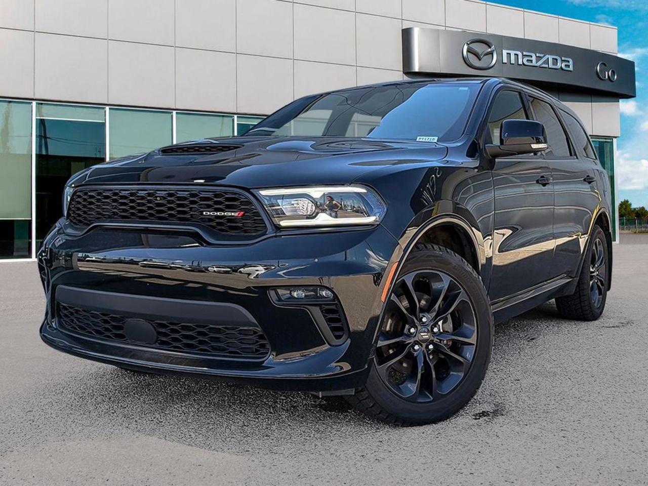 Experience power and sophistication with this pre-owned 2022 Dodge Durango GT AWD in sleek Black! Featuring a robust 3.6L Pentastar VVT V6 with Engine Start/Stop and an 8-Speed Automatic transmission, this SUV offers smooth, responsive performance. Enjoy premium comforts like leather-faced bucket seats with tungsten accent stitching, a power sunroof, and advanced climate controls.Stay connected and entertained with Uconnect 5 NAV, a 10.1 touchscreen, 9 Alpine speakers with subwoofer, Apple CarPlay, Android Auto, and a wireless charging pad. Safety is top-notch with Adaptive Cruise Control, Lane Departure Warning, Forward Collision Warning with Active Braking, and Advanced Brake Assist.Ready for any journey, this Durango offers full-time AWD, Trailer Tow Group IV with Class IV hitch receiver and trailer brake control, plus 20 Black Noise aluminum wheels wrapped in Pirelli performance tires. The Blacktop Package adds gloss black accents and sleek roof rails for an athletic stance.Drive with confidence in a spacious, tech-loaded SUV designed for family adventures and towing alike. Contact us at Go Mazda today to test drive this stunning 2022 Dodge Durango GT AWD!Go Mazda is an AMVIC licensed businessThis vehicle is showing a CarFax incident in the amount of $15,079.00