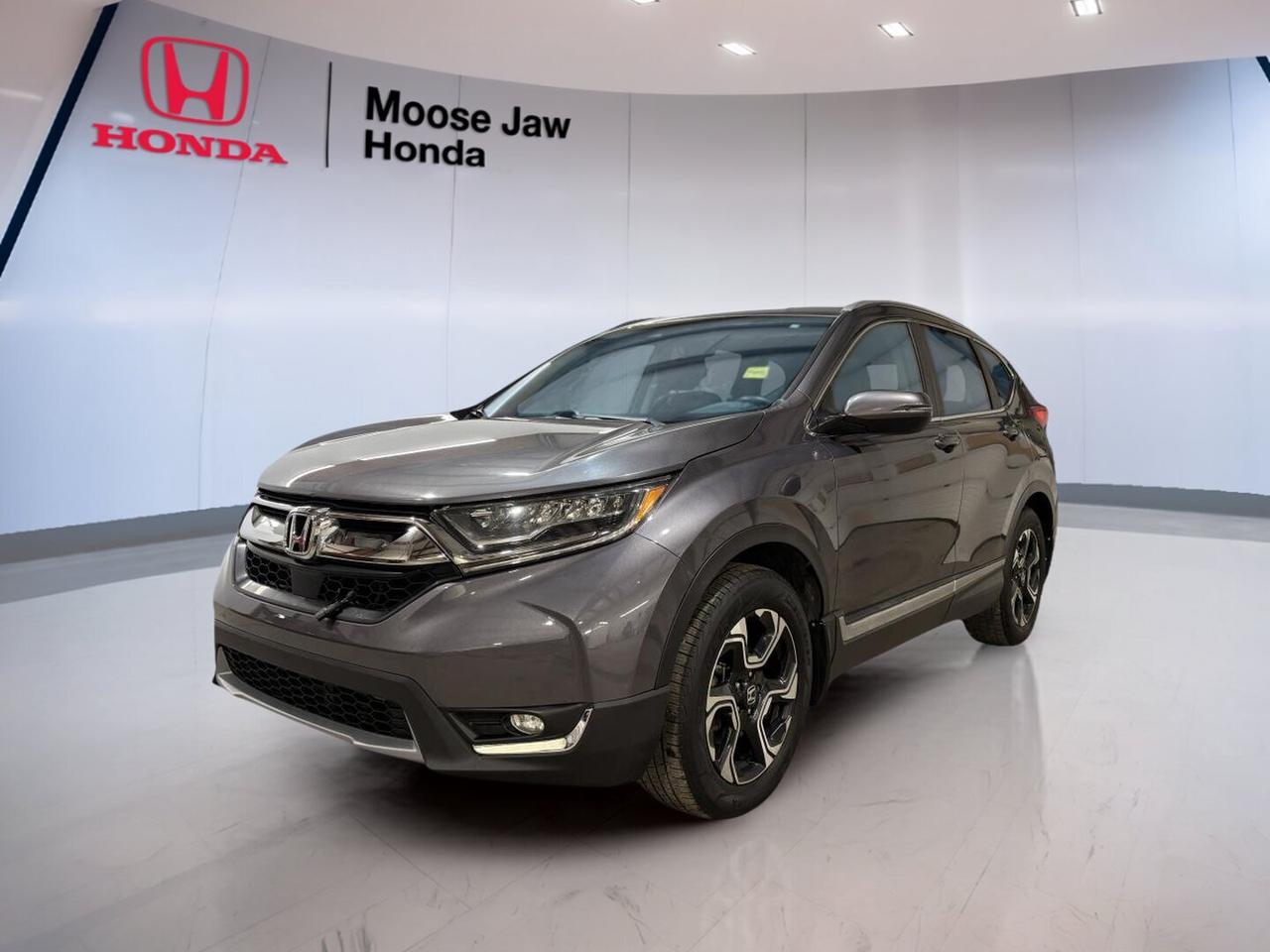 The 2018 Honda CR-V Touring is a smart choice for daily life in Moose Jaw. This used SUV pairs a fuel-saving turbocharged engine with all-wheel drive for confident travel in changing prairie weather. Finished in Grey with a Black interior, it offers a refined look, smooth CVT operation, and the proven versatility that has made the CR-V a favourite with Canadian drivers.

With 198,142 km, this 2018 Honda CR-V Touring shows the value of a well-designed Honda SUV built for real-world comfort and utility. Its 1.5L 16-valve DOHC turbocharged 4-cylinder engine delivers responsive power for city trips and highway driving alike. The cabin is roomy, the ride is composed, and the flexible cargo area helps this SUV adapt to work, errands, and weekend plans.

FEATURES OF THE CR-V Touring

»» 1.5L turbocharged four-cylinder engine power
»» Continuously Variable Transmission for smooth driving
»» All-wheel drive for added traction
»» Grey exterior with Black interior

ADVANCED SAFETY FEATURES

»» Honda Sensing safety suite on Touring
»» Multi-angle rearview camera aids reversing
»» Vehicle Stability Assist helps maintain control
»» Advanced airbag system for occupant protection

PERFORMANCE AND EFFICIENCY

»» Turbo engine offers strong everyday response
»» CVT supports smooth, efficient acceleration
»» All-wheel drive adds year-round confidence
»» Balanced ride for city and highway

COMFORT AND CONVENIENCE

»» Spacious cabin with practical everyday comfort
»» Dual-zone climate control adds convenience
»» Ample rear seat room for passengers
»» Easy entry and exit for families

TECHNOLOGY AND CONNECTIVITY

»» Clear touchscreen interface for key functions
»» Bluetooth connectivity supports hands-free calling
»» USB connectivity for device charging
»» Driver information display keeps data visible

CARGO SPACE

»» Large cargo area for daily gear
»» Split rear seats expand load flexibility
»» Low load floor eases packing
»» Cabin storage supports organized travel

AWARDS & RECOGNITIONS

»» Top Safety Pick, Insurance Institute for Highway Safety, 2018
»» Best Small Utility Vehicle, Automobile Journalists Association of Canada, 2018

WHAT OTHER OWNERS LIKE

»» Excellent cargo versatility for active lifestyles
»» Comfortable ride quality on longer trips
»» Strong fuel economy for a utility
»» Confident all-weather driving capability

This used 2018 Honda CR-V Touring at Moose Jaw Honda delivers the everyday usefulness drivers want in an SUV. It is easy to drive, easy to load, and well suited to Saskatchewan conditions. The turbocharged engine keeps it lively, while all-wheel drive helps inspire confidence when roads are wet, snowy, or uneven.

The Grey exterior gives this 2018 Honda CR-V Touring a clean, upscale presence, while the Black interior keeps the cabin timeless and easy to enjoy. For shoppers looking for a practical Honda SUV with comfort, efficiency, and flexible space, this CR-V stands out as a dependable option ready for many more kilometres ahead.

This 2018 Honda CR-V Tourings VIN is: 2HKRW2H99JH112112.<p>The 2018 Honda CR-V Touring is a smart choice for daily life in Moose Jaw. This used SUV pairs a fuel-saving turbocharged engine with all-wheel drive for confident travel in changing prairie weather. Finished in Grey with a Black interior</p>
<p> this 2018 Honda CR-V Touring shows the value of a well-designed Honda SUV built for real-world comfort and utility. Its 1.5L 16-valve DOHC turbocharged 4-cylinder engine delivers responsive power for city trips and highway driving alike. The cabin is roomy</p>
<p> and weekend plans.

FEATURES OF THE CR-V Touring

»» 1.5L turbocharged four-cylinder engine power
»» Continuously Variable Transmission for smooth driving
»» All-wheel drive for added traction
»» Grey exterior with Black interior

ADVANCED SAFETY FEATURES

»» Honda Sensing safety suite on Touring
»» Multi-angle rearview camera aids reversing
»» Vehicle Stability Assist helps maintain control
»» Advanced airbag system for occupant protection

PERFORMANCE AND EFFICIENCY

»» Turbo engine offers strong everyday response
»» CVT supports smooth</p>
<p> efficient acceleration
»» All-wheel drive adds year-round confidence
»» Balanced ride for city and highway

COMFORT AND CONVENIENCE

»» Spacious cabin with practical everyday comfort
»» Dual-zone climate control adds convenience
»» Ample rear seat room for passengers
»» Easy entry and exit for families

TECHNOLOGY AND CONNECTIVITY

»» Clear touchscreen interface for key functions
»» Bluetooth connectivity supports hands-free calling
»» USB connectivity for device charging
»» Driver information display keeps data visible

CARGO SPACE

»» Large cargo area for daily gear
»» Split rear seats expand load flexibility
»» Low load floor eases packing
»» Cabin storage supports organized travel

AWARDS & RECOGNITIONS

»» Top Safety Pick</p>
<p> 2018

WHAT OTHER OWNERS LIKE

»» Excellent cargo versatility for active lifestyles
»» Comfortable ride quality on longer trips
»» Strong fuel economy for a utility
»» Confident all-weather driving capability

This used 2018 Honda CR-V Touring at Moose Jaw Honda delivers the everyday usefulness drivers want in an SUV. It is easy to drive</p>
<p> while the Black interior keeps the cabin timeless and easy to enjoy. For shoppers looking for a practical Honda SUV with comfort</p>
<p> this CR-V stands out as a dependable option ready for many more kilometres ahead.

This 2018 Honda CR-V Tourings VIN is: 2HKRW2H99JH112112.</p>
