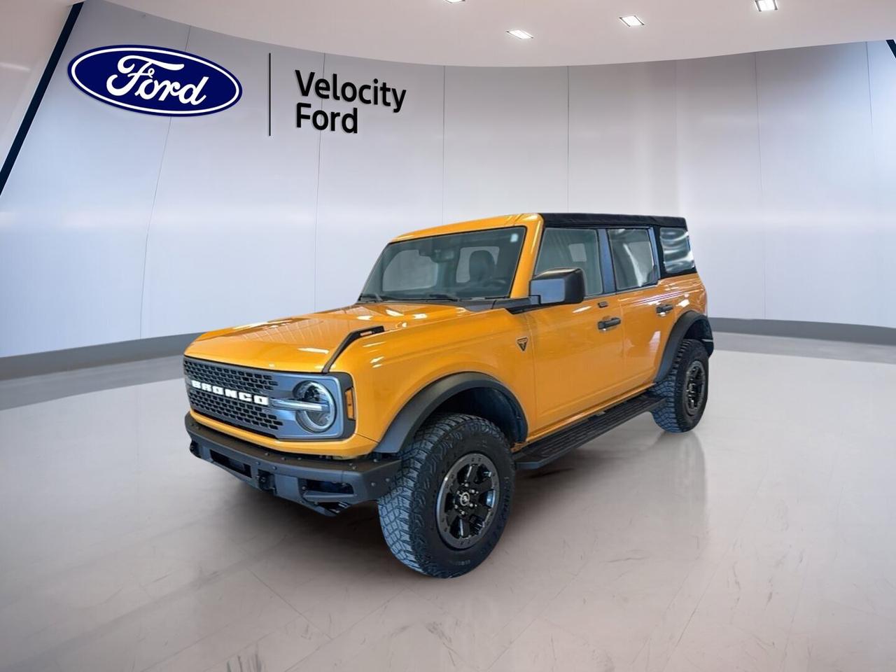 // ACCIDENT FREE!! //
// SINGLE OWNER! //

Built for real adventure, this 2021 Ford Bronco Badlands 4 Door Advanced 4x4 COMING SOON is ready for Moose Jaw roads, trails, and changing weather. CARFAX Canada reports no accidents and a single owner. With 57,107 km, bold orange paint, black interior, and a 2.7-litre unleaded engine, it brings serious capability.

FEATURES OF THE Bronco Badlands 4 Door Advanced 4x4 COMING SOON
»» Advanced 4x4 system boosts tough terrain control
»» Badlands trim tuned for serious off-road use
»» Four-door body adds easy passenger access
»» Removable roof design adds open-air freedom

ADVANCED SAFETY FEATURES
»» Backup camera helps with reversing confidence
»» Side impact airbags add occupant protection
»» Head side airbags support safer travel
»» Child safety locks help protect passengers

PERFORMANCE AND EFFICIENCY
»» 2.7-litre engine delivers strong turbocharged power
»» Four-wheel drive supports traction off pavement
»» Limited slip differential aids rough-surface grip
»» Off-road tires enhance trail-ready capability

COMFORT AND CONVENIENCE
»» Front air conditioning keeps cabin comfortable
»» Cruise control supports relaxed highway driving
»» Heated mirrors help in cold weather
»» Power windows add daily driving ease

TECHNOLOGY AND CONNECTIVITY
»» Bluetooth integration supports hands-free phone use
»» WiFi hotspot helps keep devices connected
»» Steering wheel audio controls improve convenience
»» Satellite radio offers more listening choice

CARGO SPACE
»» Rear trunk access simplifies loading gear
»» Four-door layout improves everyday practicality
»» Spare tire supports remote trip confidence
»» Flexible cabin suits passengers and cargo

AWARDS & RECOGNITIONS
»» North American Utility Vehicle winner, North American Car Awards, 2021
»» Best 4x4 and Off-Road SUV, Auto123.com, 2021

WHAT OTHER OWNERS LIKE
»» Strong off-road capability inspires driver confidence
»» Removable roof adds fun open-air driving
»» Powerful engine delivers quick everyday response
»» Rugged design suits active outdoor lifestyles

This used Ford Bronco is equipped with key features drivers want most, including automatic headlights, LED headlamps, push button start, power steering, anti-lock braking system, stability control, tinted windows, electric mirrors, heated mirrors, and tire pressure monitoring. It also includes driver and passenger airbags, a passenger airbag sensor, and illuminated vanity mirrors for both front occupants.

This Ford Bronco stands out with its blend of rugged utility and everyday ease. The convertible design adds a unique open-top experience, while the automatic transmission helps make city and highway driving simple. At Velocity Ford in Moose Jaw, this SUV is a great fit for drivers who want proven capability, useful features, and true Bronco character.

This 2021 Ford Bronco Badlands 4 Door Advanced 4x4 COMING SOONs VIN is: 1FMEE5DP5MLA97580.