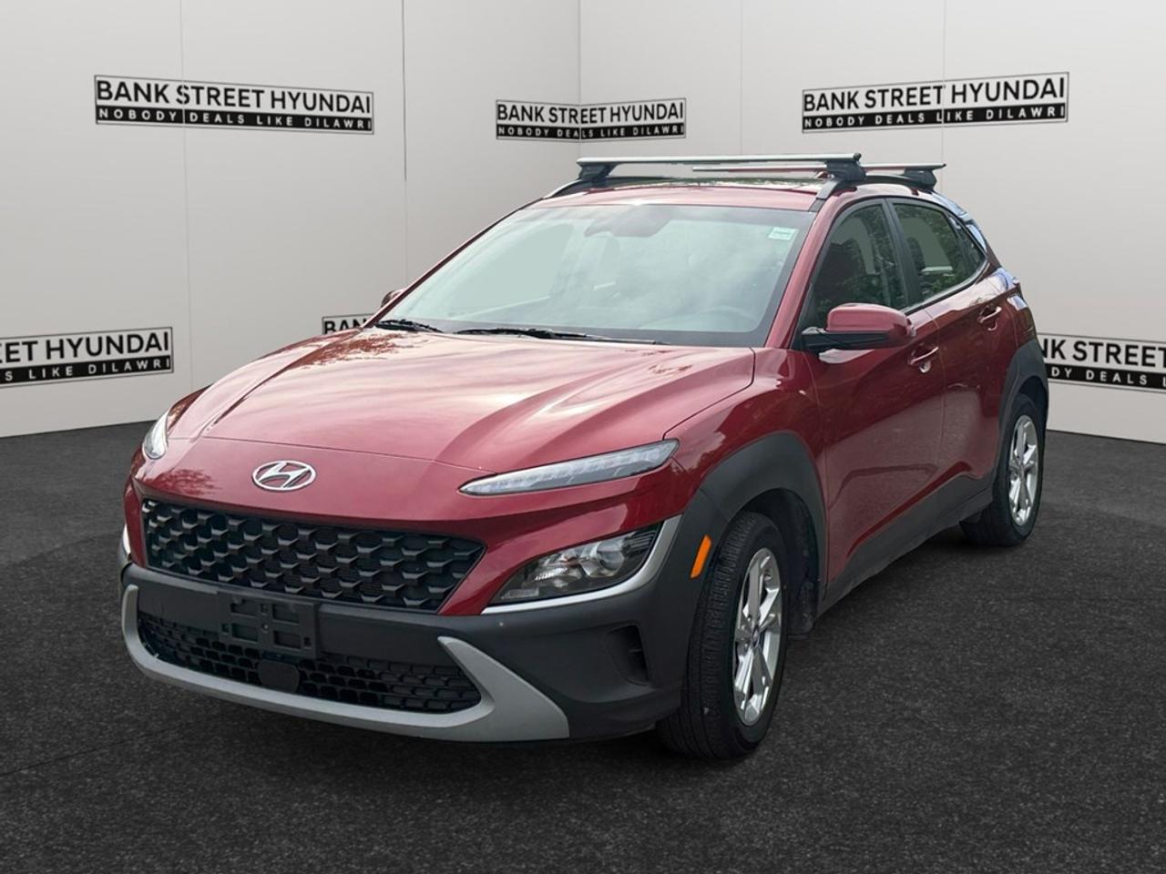 The 2023 Hyundai Kona 2.0L Preferred AWD w/Sun & Leather Package is here in a striking red color, showcasing its all-wheel-drive prowess and confident handling. This SUV combines style and practicality, making it an ideal choice for varied road conditions in Canada. The exterior shines with the vibrant red hue and elegant alloy wheels. Inside, youre greeted with the luxurious comfort of leather seats and a leather steering wheel, ensuring every journey is enjoyable. Crafted for your satisfaction, heated front seats and a heated steering wheel provide coziness on chilly days. The Kona is equipped with cutting-edge technology to enhance every drive. Stay connected through the Bluetooth connection and smart device integration while the advanced navigation system guides your adventures. The backup camera, lane assist, adaptive cruise control, and brake assist prioritize your safety and convenience on every trip. This vehicle is perfect for those seeking both comfort and technology. Whether youre an urban explorer or enjoy long road trips, the Kona offers the features you need. Contact Bank Street Hyundai today for more information and to take this exceptional SUV for a test drive.