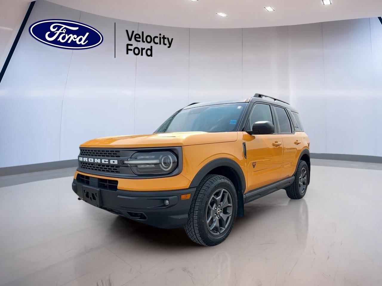 // ACCIDENT FREE!! //

Meet the 2022 Ford Bronco Sport Badlands 4x4 at Velocity Ford in Moose Jaw. This used SUV blends rugged capability with everyday comfort in a bold Orange finish and Black interior. CARFAX Canada reports no accident, giving you added peace of mind. With 88,907 km, automatic transmission, and a 2.0-litre unleaded engine, this Bronco Sport Badlands 4x4 is ready for work, weekends, and all-weather travel.

Built for drivers who want real utility, the 2022 Ford Bronco Sport Badlands 4x4 stands out with its standard 4WD system, off-road-focused setup, and practical cabin design. Four doors make access easy for passengers and gear, while its confident stance, heated mirrors, and LED headlamps help it feel at home in the city or on rougher roads around Saskatchewan.

FEATURES OF THE Bronco Sport Badlands 4x4
»» 2.0-litre turbo engine for strong response
»» Standard 4WD for confident traction
»» Off-road tires for added trail grip
»» Rear tow hook supports recovery situations

ADVANCED SAFETY FEATURES
»» Backup camera helps with reverse visibility
»» Blind spot monitor adds lane awareness
»» Lane departure warning supports safer travel
»» Side and head airbags enhance protection

PERFORMANCE AND EFFICIENCY
»» 2.0-litre engine delivers solid everyday power
»» Eight-speed automatic supports smooth shifting
»» Limited slip differential boosts traction control
»» Four-wheel drive handles changing road conditions

COMFORT AND CONVENIENCE
»» Heated front seats add cold-weather comfort
»» Driver power seat improves daily support
»» Automatic climate control maintains cabin comfort
»» Push button start adds simple convenience

The 2022 Ford Bronco Sport Badlands 4x4 gives you a cabin that is easy to use and well suited for daily driving. Power windows, power steering, cruise control, and an adjustable steering wheel help make longer trips easier. Heated mirrors, rear window defroster, and automatic headlights also support year-round comfort in Canadian conditions.

TECHNOLOGY AND CONNECTIVITY
»» Bluetooth integration supports hands-free communication
»» WiFi hotspot keeps devices connected
»» Steering wheel audio controls ease use
»» Satellite radio expands entertainment choices

CARGO SPACE
»» Rear trunk access simplifies loading items
»» Four-door layout improves passenger entry
»» Spare tire adds roadside reassurance
»» Flexible SUV design suits active lifestyles

Inside, the 2022 Ford Bronco Sport Badlands 4x4 keeps things practical with useful storage, tinted windows, ambient lighting, and a leather-wrapped steering wheel. The auto-dimming rearview mirror, illuminated vanity mirrors, and front air conditioning add thoughtful touches. This SUV is a smart fit for drivers who want versatility without giving up comfort or technology.

AWARDS & RECOGNITIONS
»» Top Safety Pick, Insurance Institute for Highway Safety, 2022

WHAT OTHER OWNERS LIKE
»» Strong turbo power for daily driving
»» Confident traction in poor weather
»» Useful cargo room for active lifestyles
»» Easy-to-use controls and cabin layout

This 2022 Ford Bronco Sport Badlands 4x4s VIN is: 3FMCR9D95NRE05239.