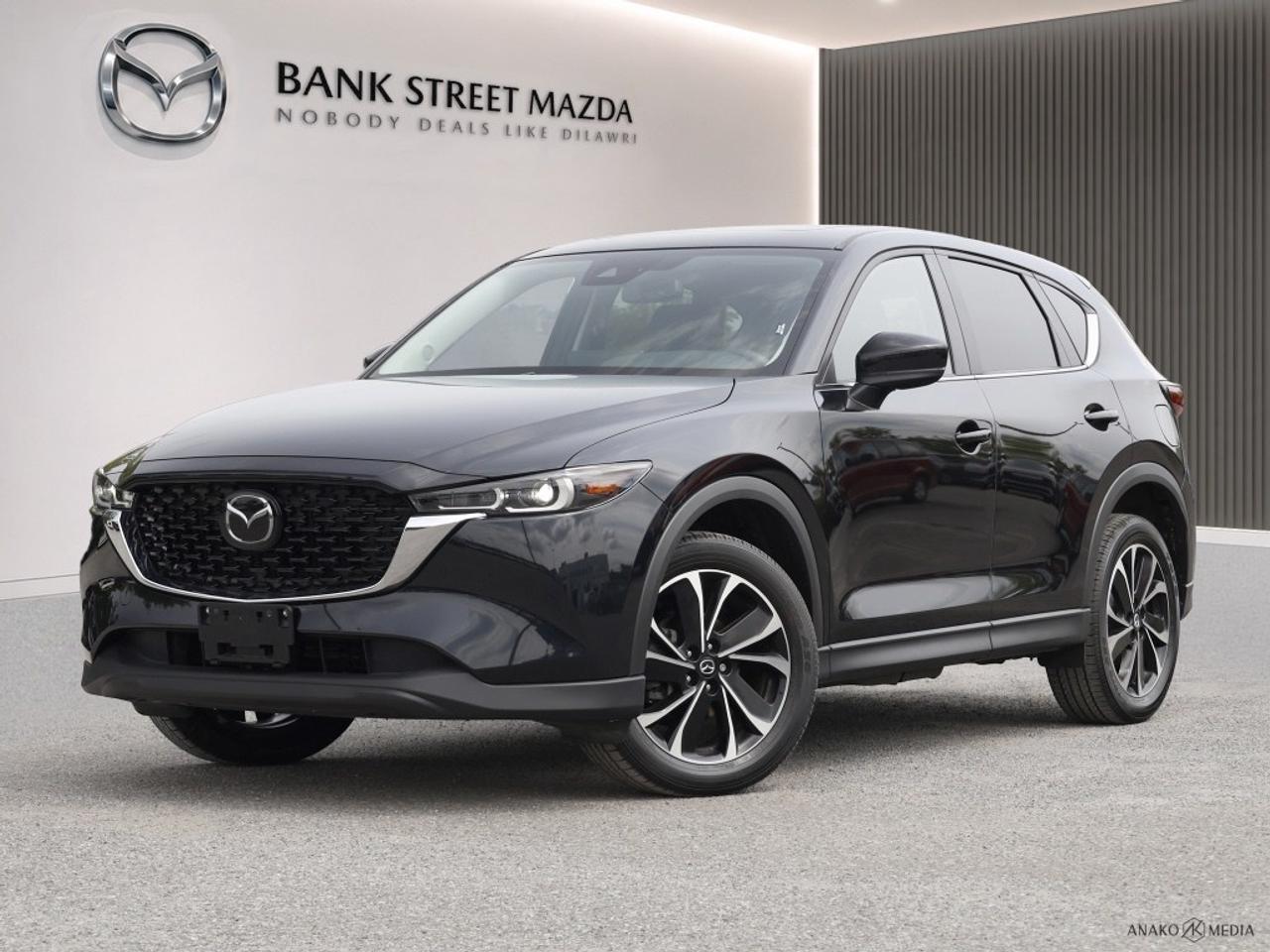 The 2023 Mazda CX-5 GS AWD in an elegant color combines style and performance with its advanced all-wheel drive system and smooth automatic transmission. Perfect for those seeking a reliable SUV that stands out on the road with its alloy wheels and modern aerodynamic design. Inside, the Mazda CX-5 offers a refined interior with comfortable heated seats and a spacious cabin, making every journey enjoyable. Keyless entry and power seats add convenience, while the high-quality finishing touches provide a sense of luxury. The technology features include a user-friendly smart device integration system, Bluetooth connection for hands-free calls, and a crisp backup camera to ensure safety and ease of parking. In terms of safety, the lane assist and brake assist technologies offer peace of mind on every drive. This SUV is ideal for families and adventure seekers who value both comfort and safety. Contact Bank Street Mazda to learn more about this 2023 model and schedule a test drive. Your journey begins with us!