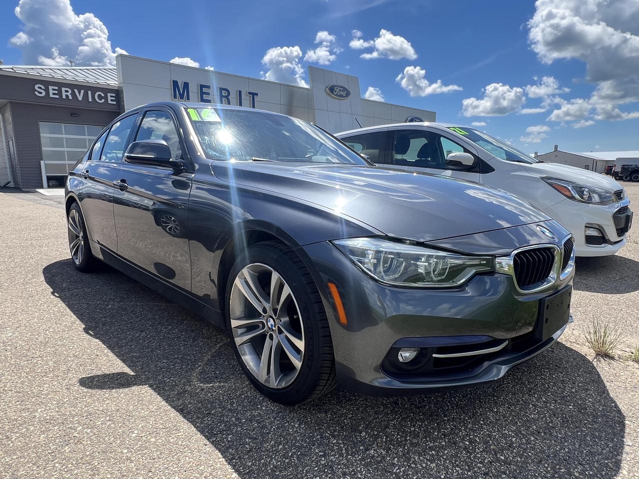 This 2016 BMW 3 Series 328i xDrive is a well-equipped sport sedan that delivers a compelling blend of all-weather confidence, premium technology, and driving refinement. Finished in Mineral Gray Metallic with a Black and Red Highlight interior, it stands out with the Harman/Kardon Surround Sound System and Premium Package already on board  giving you luxury-grade features without the new-car price tag.

Key Highlights:
- AWD (xDrive) system for confident traction in all seasons
- Harman/Kardon Surround Sound System for an elevated audio experience
- Premium Package included  memory seat settings, auto-dimming mirrors, and more
- Brushed Aluminum Trim w/ Black High-Gloss Accent for a refined interior aesthetic
- Sport Automatic Transmission with steering wheel-mounted controls
- Sport Leather Steering Wheel with integrated cruise control
- Body-colored heated, power-folding, auto-dimming side mirrors with turn signals
- Comprehensive airbag system including knee airbags and curtain airbags for added protection

With 112,800 km on a proven 2.0L turbocharged 4-cylinder engine and a strong list of comfort and safety features, this 3 Series represents excellent value for the driver who appreciates German engineering without compromise.

Interested in taking it for a drive? Contact Merit Ford Sales today to book a test drive, ask any questions, or get started on your purchase. Our team is here to make your next vehicle decision a confident one.