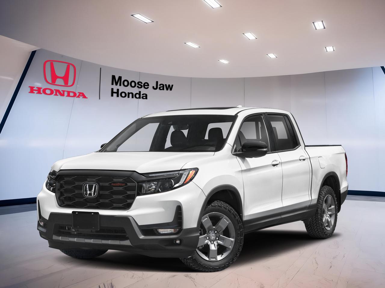 Built for Canadian roads and ready for work or play, the brand new 2026 Honda Ridgeline Trailsport brings proven V6 power, confident all-wheel drive, and smart truck utility to Moose Jaw Honda. Finished in White with a Black interior, this midsize pickup blends comfort, capability, and everyday ease in one well-rounded package.

The 2026 Honda Ridgeline Trailsport stands out with a durable unibody design, a smooth 9-Speed Automatic transmission, and Honda intelligent all-wheel drive. It is made for drivers who want a truck that feels refined in town, stable on the highway, and capable when the pavement ends.

FEATURES OF THE Ridgeline Trailsport
»» Trail-ready suspension tuning for rough roads
»» Standard all-wheel drive for added confidence
»» V6 power for strong daily performance
»» Durable design with practical truck versatility

ADVANCED SAFETY FEATURES
»» Honda Sensing suite supports safer driving
»» Collision mitigation braking can help react
»» Lane keeping assist supports highway confidence
»» Adaptive cruise control helps reduce fatigue

PERFORMANCE AND EFFICIENCY
»» 3.5-litre i-VTEC V6 delivers strong power
»» 9-speed automatic shifts smoothly and quickly
»» All-wheel drive boosts traction in Canada
»» Unibody truck design improves ride comfort

COMFORT AND CONVENIENCE
»» Spacious cabin offers everyday driving comfort
»» Black interior gives a clean look
»» Four-door layout helps passenger access easily
»» Smooth ride suits commuting and road trips

TECHNOLOGY AND CONNECTIVITY
»» Clear driver information supports easy monitoring
»» Modern controls are simple to use
»» Automatic transmission includes manual shift control
»» Useful cabin tech supports daily driving

TRUCK FEATURES
»» Strong V6 supports confident towing capability
»» Pickup bed adds everyday hauling flexibility
»» All-wheel drive helps on loose surfaces
»» Rugged setup suits work and weekend use

CARGO SPACE
»» Truck bed handles gear and supplies
»» Cabin storage helps organize smaller items
»» Flexible layout supports passengers and cargo
»» Practical design suits active daily life

WHAT OTHER OWNERS LIKE
»» Smooth ride compared with traditional trucks
»» Useful bed and clever cargo solutions
»» Strong V6 power for daily driving
»» Comfortable cabin for long-distance travel

The 2026 Honda Ridgeline Trailsport is a smart choice for drivers who need real truck function without giving up comfort. Its White exterior looks clean and confident, while the Black interior keeps the cabin practical and easy to maintain through changing Prairie seasons.

At Moose Jaw Honda in Moose Jaw, this brand new 2026 Honda Ridgeline Trailsport is ready to help with commuting, family duty, road trips, and weekend projects. If you want a pickup with dependable Honda engineering, smooth power delivery, and versatile all-wheel-drive capability, this truck deserves a close look.

This 2026 Honda Ridgeline Trailsports VIN is: 5FPYK3F66TB501725.<p> and everyday ease in one well-rounded package.

The 2026 Honda Ridgeline Trailsport stands out with a durable unibody design</p>
<p> and Honda intelligent all-wheel drive. It is made for drivers who want a truck that feels refined in town</p>
<p> and capable when the pavement ends.

FEATURES OF THE Ridgeline Trailsport
»» Trail-ready suspension tuning for rough roads
»» Standard all-wheel drive for added confidence
»» V6 power for strong daily performance
»» Durable design with practical truck versatility

ADVANCED SAFETY FEATURES
»» Honda Sensing suite supports safer driving
»» Collision mitigation braking can help react
»» Lane keeping assist supports highway confidence
»» Adaptive cruise control helps reduce fatigue

PERFORMANCE AND EFFICIENCY
»» 3.5-litre i-VTEC V6 delivers strong power
»» 9-speed automatic shifts smoothly and quickly
»» All-wheel drive boosts traction in Canada
»» Unibody truck design improves ride comfort

COMFORT AND CONVENIENCE
»» Spacious cabin offers everyday driving comfort
»» Black interior gives a clean look
»» Four-door layout helps passenger access easily
»» Smooth ride suits commuting and road trips

TECHNOLOGY AND CONNECTIVITY
»» Clear driver information supports easy monitoring
»» Modern controls are simple to use
»» Automatic transmission includes manual shift control
»» Useful cabin tech supports daily driving

TRUCK FEATURES
»» Strong V6 supports confident towing capability
»» Pickup bed adds everyday hauling flexibility
»» All-wheel drive helps on loose surfaces
»» Rugged setup suits work and weekend use

CARGO SPACE
»» Truck bed handles gear and supplies
»» Cabin storage helps organize smaller items
»» Flexible layout supports passengers and cargo
»» Practical design suits active daily life

WHAT OTHER OWNERS LIKE
»» Smooth ride compared with traditional trucks
»» Useful bed and clever cargo solutions
»» Strong V6 power for daily driving
»» Comfortable cabin for long-distance travel

The 2026 Honda Ridgeline Trailsport is a smart choice for drivers who need real truck function without giving up comfort. Its White exterior looks clean and confident</p>
<p> while the Black interior keeps the cabin practical and easy to maintain through changing Prairie seasons.

At Moose Jaw Honda in Moose Jaw</p>
<p> this truck deserves a close look.

This 2026 Honda Ridgeline Trailsports VIN is: 5FPYK3F66TB501725.</p>