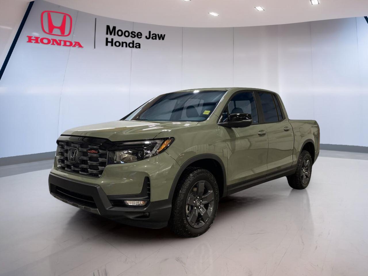 Built for work, travel, and daily life, the brand new 2026 Honda Ridgeline Trailsport brings smart truck utility with the comfort of a refined SUV. Finished in Green with a Black interior, this all-wheel-drive pickup pairs a proven 3.5-litre V6 engine with a 9-speed automatic transmission for smooth, confident power.

The 2026 Honda Ridgeline Trailsport stands out with its unibody design, composed ride, and practical bed features. It is made for drivers who want towing strength, year-round traction, and easy day-to-day comfort in Moose Jaw. This truck feels ready for the highway, gravel roads, and busy city errands alike.

FEATURES OF THE Ridgeline Trailsport

»» Trail-ready all-wheel drive for added confidence
»» 3.5-litre V6 power for strong response
»» 9-speed automatic shifts smooth and quick
»» Green exterior adds bold truck character

TRUCK FEATURES

»» Tows up to 2,268 kg when equipped
»» Lockable in-bed trunk adds secure storage
»» Dual-action tailgate boosts loading convenience
»» Composite truck bed resists dents and corrosion

ADVANCED SAFETY FEATURES

»» Honda Sensing helps support safer driving
»» Collision mitigation braking can assist stops
»» Lane keeping assist helps steady travel
»» Road departure mitigation adds extra awareness

PERFORMANCE AND EFFICIENCY

»» 3.5-litre V6 delivers strong everyday power
»» Intelligent all-wheel drive aids tough traction
»» 9-speed automatic supports smooth highway cruising
»» Unibody construction helps balanced ride quality

COMFORT AND CONVENIENCE

»» Spacious cabin supports daily driving comfort
»» Four full doors improve passenger access
»» Dual-action tailgate simplifies cargo handling
»» Black interior offers clean, modern style

TECHNOLOGY AND CONNECTIVITY

»» Clear infotainment screen keeps functions accessible
»» Bluetooth connectivity supports hands-free communication
»» Multiple USB ports help charge devices
»» Driver information display keeps data visible

CARGO SPACE

»» Truck bed handles gear with ease
»» In-bed trunk stores valuables out of sight
»» Wide bed opening helps loading larger items
»» Flexible space suits work and weekend use

WHAT OTHER OWNERS LIKE

»» Smooth ride uncommon in midsize trucks
»» Clever in-bed trunk adds daily usefulness
»» Strong V6 power feels confident
»» All-wheel drive helps in Canadian weather

The brand new 2026 Honda Ridgeline Trailsport is a smart choice for drivers who need real truck function without giving up comfort. Its V6 performance, intelligent all-wheel drive, and practical cargo solutions make it easy to enjoy every trip, whether you are heading to the job site or leaving Moose Jaw for the weekend.

This 2026 Honda Ridgeline Trailsports VIN is: 5FPYK3F6XTB501775.<p> the brand new 2026 Honda Ridgeline Trailsport brings smart truck utility with the comfort of a refined SUV. Finished in Green with a Black interior</p>
<p> this all-wheel-drive pickup pairs a proven 3.5-litre V6 engine with a 9-speed automatic transmission for smooth</p>
<p> and busy city errands alike.

FEATURES OF THE Ridgeline Trailsport

»» Trail-ready all-wheel drive for added confidence
»» 3.5-litre V6 power for strong response
»» 9-speed automatic shifts smooth and quick
»» Green exterior adds bold truck character

TRUCK FEATURES

»» Tows up to 2</p>
<p>268 kg when equipped
»» Lockable in-bed trunk adds secure storage
»» Dual-action tailgate boosts loading convenience
»» Composite truck bed resists dents and corrosion

ADVANCED SAFETY FEATURES

»» Honda Sensing helps support safer driving
»» Collision mitigation braking can assist stops
»» Lane keeping assist helps steady travel
»» Road departure mitigation adds extra awareness

PERFORMANCE AND EFFICIENCY

»» 3.5-litre V6 delivers strong everyday power
»» Intelligent all-wheel drive aids tough traction
»» 9-speed automatic supports smooth highway cruising
»» Unibody construction helps balanced ride quality

COMFORT AND CONVENIENCE

»» Spacious cabin supports daily driving comfort
»» Four full doors improve passenger access
»» Dual-action tailgate simplifies cargo handling
»» Black interior offers clean</p>
<p> modern style

TECHNOLOGY AND CONNECTIVITY

»» Clear infotainment screen keeps functions accessible
»» Bluetooth connectivity supports hands-free communication
»» Multiple USB ports help charge devices
»» Driver information display keeps data visible

CARGO SPACE

»» Truck bed handles gear with ease
»» In-bed trunk stores valuables out of sight
»» Wide bed opening helps loading larger items
»» Flexible space suits work and weekend use

WHAT OTHER OWNERS LIKE

»» Smooth ride uncommon in midsize trucks
»» Clever in-bed trunk adds daily usefulness
»» Strong V6 power feels confident
»» All-wheel drive helps in Canadian weather

The brand new 2026 Honda Ridgeline Trailsport is a smart choice for drivers who need real truck function without giving up comfort. Its V6 performance</p>
<p> whether you are heading to the job site or leaving Moose Jaw for the weekend.

This 2026 Honda Ridgeline Trailsports VIN is: 5FPYK3F6XTB501775.</p>