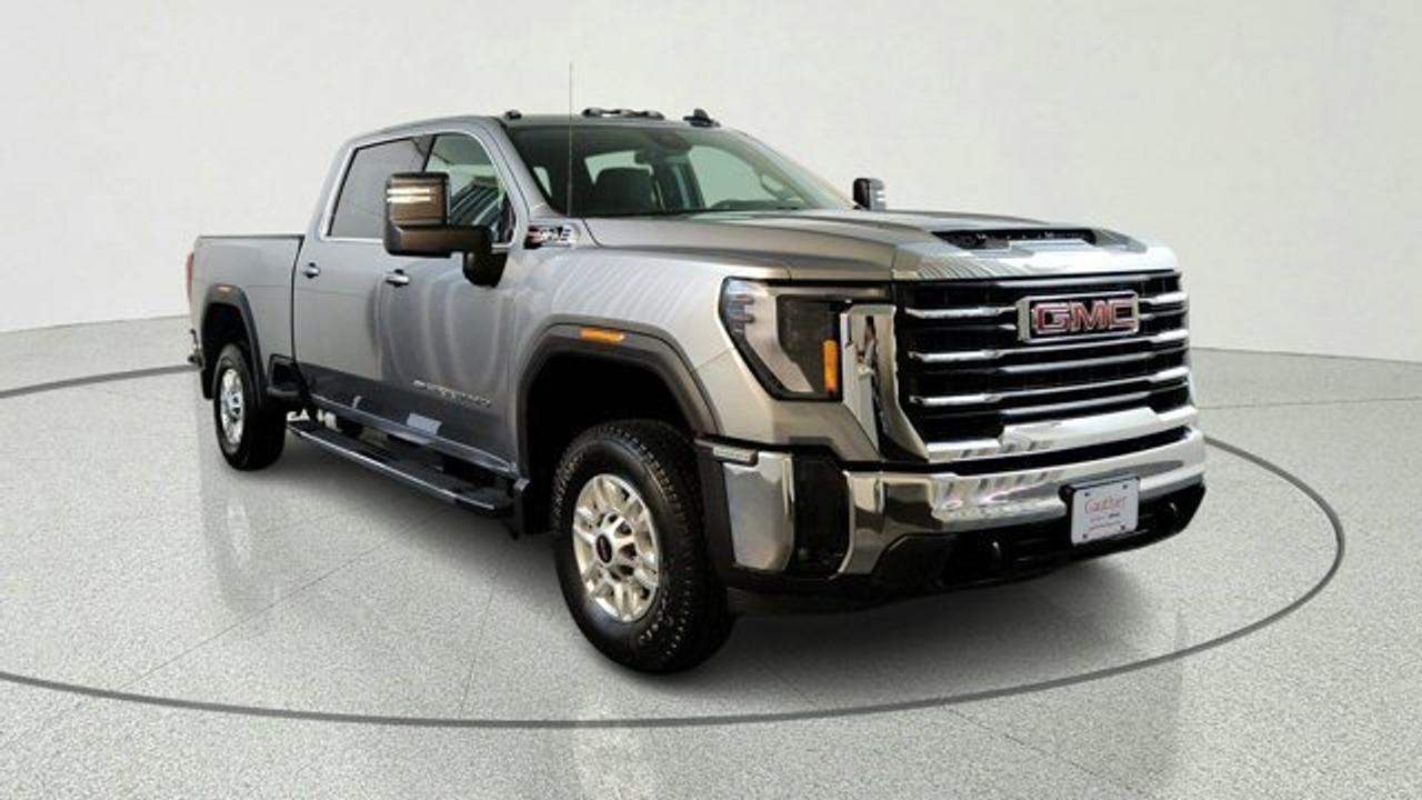 The 2026 GMC Sierra 2500HD SLE is a well-equipped heavy-duty pickup that balances work-ready capability with upgraded comfort and technology, featuring a bold exterior design, multiple cab and bed configurations, and a more refined interior than the base trim. It comes standard with a large 13.4-inch infotainment touchscreen, a 12.3-inch digital driver display, keyless entry with push-button start, and features like a Bose audio system, advanced trailering tech, the MultiPro tailgate and the X31 offroad package. Powered by a standard 6.6-liter V8 gas engine it delivers strong towing performance along with essential safety features such as automatic emergency braking and lane-departure warning.