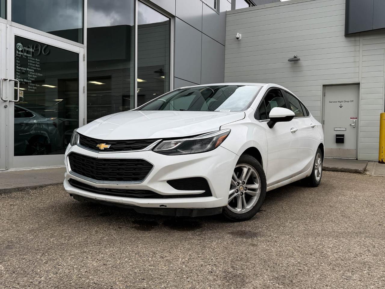 Experience reliable efficiency and modern convenience with this pre-owned 2016 Chevrolet Cruze LT 4dr Sedan in crisp White. Powered by a peppy 1.4L Turbo DOHC 4-Cyl engine paired with a smooth 6-speed automatic transmission, this Cruze offers excellent fuel economy and confident handling.Enjoy comfort with heated front bucket seats trimmed in cloth, and stay connected on the road with Chevrolet MyLink featuring a 7 touchscreen, SiriusXM satellite radio, voice-activated audio, and mobile hotspot access. Safety is comprehensive with 10 airbags, rearview camera, stability control, and hill start assist.Additional features include front ventilated disc brakes, alloy 16-inch wheels, power door locks and mirrors, cruise control, and capless fuel filler for added convenience. This Cruze blends technology, comfort, and efficiency perfectlyschedule your test drive today and drive confidently tomorrow!Go Mazda is an AMVIC licensed businessThis vehicle is showing CarFax incidents in the amount of $1,960.94 and $5,804.04