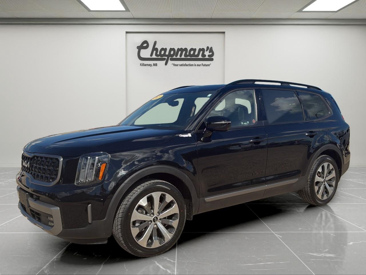 <p>Finished in Black with a Black interior, this 2023 Kia Telluride SX AWD delivers premium comfort, advanced technology, and confident all-weather capability in an award-winning three-row SUV. With bold styling, seating for up to eight, and an impressive list of luxury features, the Telluride SX is equally at home on family road trips, daily commutes, and weekend adventures.</p><p>Powered by a proven 3.8L GDI V6 engine paired with an 8-speed automatic transmission, the Telluride offers smooth power delivery and confident performance. Intelligent All-Wheel Drive, advanced driver assistance technologies, and a refined ride make this SUV an exceptional choice for Canadian driving conditions.</p><h3>Performance & Capability</h3><p> 3.8L GDI V6 engine  8-speed automatic transmission  All-Wheel Drive (AWD)  Drive Mode Select with multiple terrain modes  Hill Descent Control  Hill Start Assist  Trailer Sway Control  Trailer wiring harness  Electronic parking brake with Auto Hold  Independent front and rear suspension  Brake-actuated limited-slip differential</p><h3>Interior Comfort & Convenience</h3><p> Leather seating surfaces  Heated and ventilated front seats  Heated second-row seats  Heated leather-wrapped steering wheel  Dual-zone automatic climate control with rear climate controls  Smart Cruise Control with Stop & Go  Power driver's seat with memory settings  Power front passenger seat  Smart Power Liftgate  Power sunroof  HomeLink universal garage door opener  Auto-dimming rearview mirror  60/40 split-folding third-row seats  Multiple USB charging ports throughout the cabin</p><h3>Technology & Connectivity</h3><p> Dual 12.3" panoramic digital displays  Navigation system  Apple CarPlay & Android Auto  Harman Kardon premium audio system  Bluetooth hands-free connectivity  Wireless phone charging  Digital Driver Information Centre  Voice recorder  SiriusXM Satellite Radio  Kia Connect connected services  Steering wheel-mounted audio controls</p><h3>Safety & Driver Assistance</h3><p> Highway Driving Assist 2 (HDA 2)  Forward Collision-Avoidance Assist  Blind Spot View Monitor  Blind Spot Collision-Avoidance Assist  Surround View Monitor (360° camera)  Front and Rear Parking Distance Warning  Smart Cruise Control with Stop & Go  Lane Keeping Assist  Lane Following Assist  Rear Cross-Traffic Collision-Avoidance Assist  Safe Exit Assist  Driver Attention Warning  Rear Occupant Alert  Automatic High Beam Assist</p><h3>Exterior Highlights</h3><p> Black exterior finish  LED projector headlights  LED daytime running lights  LED fog lamps  LED taillights  Power-folding heated outside mirrors with integrated turn signals  Smart Power Liftgate  Deep-tinted privacy glass  Roof rails  Rear spoiler  Premium alloy wheels</p><p>The 2023 Kia Telluride SX AWD offers an exceptional combination of luxury, technology, and capability. With its premium interior, advanced safety systems, and spacious three-row design, it's a versatile SUV that's ready for everything from family vacations to everyday errands.</p><p>Price Includes Dealer Fee.</p><p>Price Excludes PST & GST.</p><p>Financing Options Available, Call For More Details.</p> <p><strong>*While every reasonable effort is made to ensure the accuracy of this information, we are not responsible for any error or omissions contained on these pages. Please verify any information in question with Chapman Motors Ltd.</strong></p>