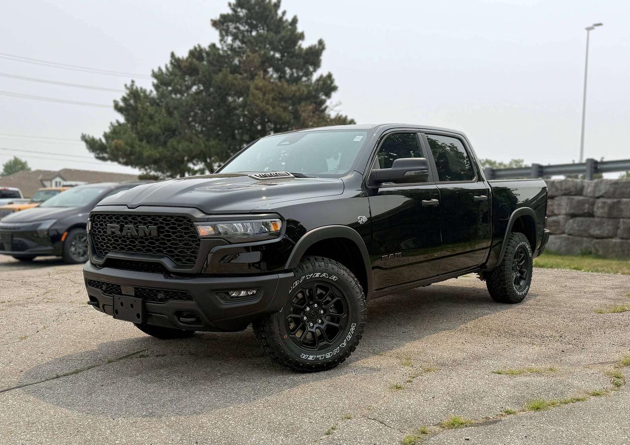Bold and unmistakable, our New 2026 RAM 1500 Rebel Crew Cab 4X4 in Diamond Black Crystal Pearl stands out with aggressive design and off-road capability. Powered by a 5.7 Litre HEMI eTorque V8 and a 48V Mild-Hybrid system offering 395hp paired with an 8 Speed Automatic transmission engineered for off-road domination. A raised ride height, performance shocks, and a shift-on-demand transfer case can take this Four Wheel Drive truck further down the trail, and it achieves approximately 9.8L/100km on the highway. Our fierce and stylish RAM features LED lighting, fog lamps, a sport performance hood, bold graphics, lower two-tone paint, alloy wheels, off-road fender flares, and robust skid plates.  Our Rebel cabin is ready for rough terrain thanks to its heated cloth front seats, eight-way power for the driver, a heated-wrapped steering wheel, dual-zone automatic climate control, 12V/115V outlets, a power rear window, and remote start. Off-Road Info Pages enhance the infotainment system, which bundles a 12-inch driver display, 12-inch touchscreen, full-color navigation, WiFi compatibility, Android Auto&reg;/Apple CarPlay&reg;, Bluetooth&reg;, voice control, and nine-speaker audio.  For safetys sake, RAM supplies front/rear auto braking, blind-spot monitoring, adaptive cruise control, active lane management, trailer sway damping, hill-start assistance, and more. Committed to truck leadership, our 1500 Rebel is a compelling choice! Save this Page and Call for Availability. We Know You Will Enjoy Your Test Drive Towards Ownership!