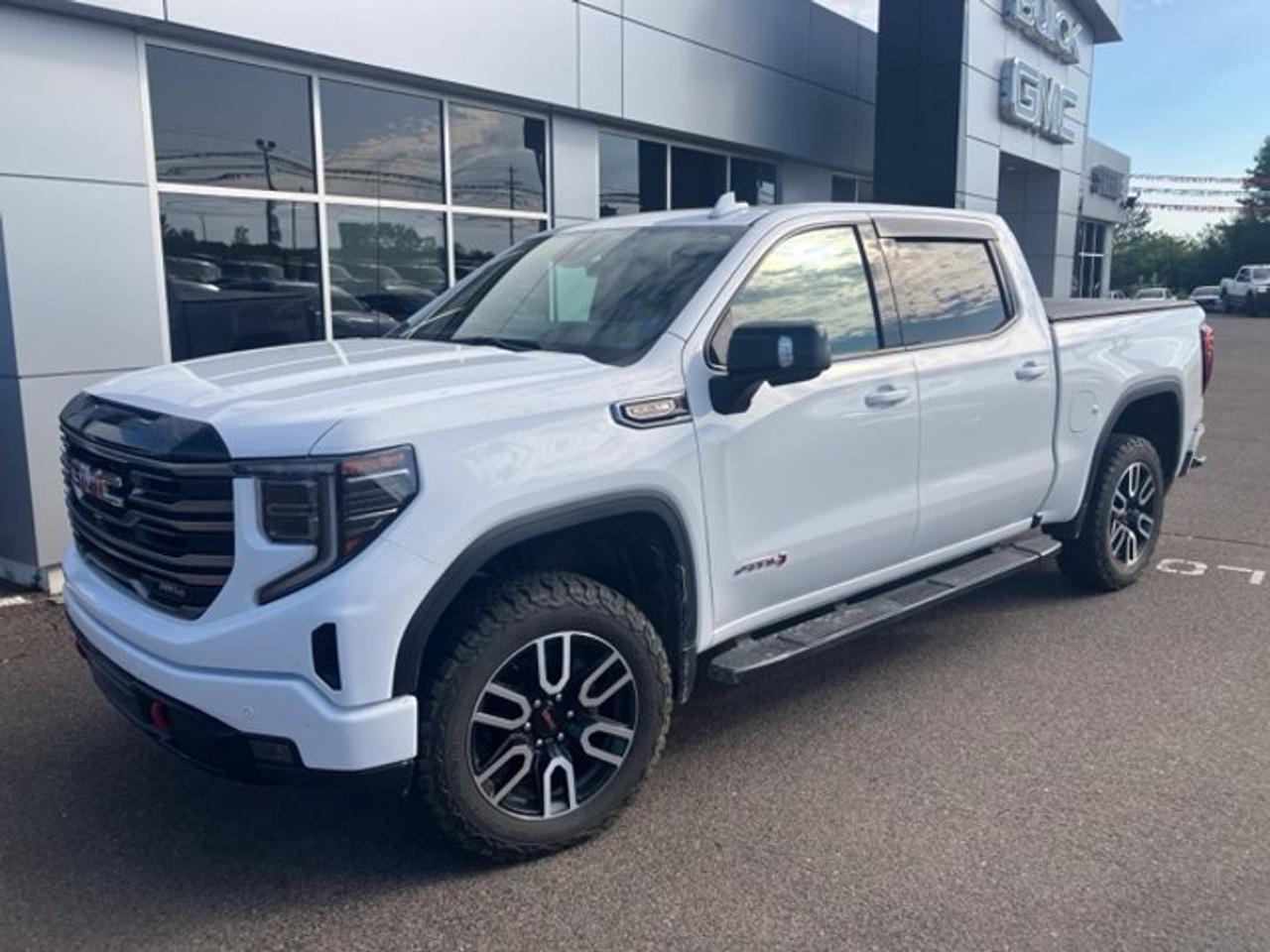 New Price!CARFAX Canada No Reported AccidentsSummit White 2025 GMC Sierra 1500 AT4 4WD 10-Speed Automatic EcoTec3 6.2L V810-Speed Automatic, 4WD, Jet Black With Kalahari Accents Leather, 10-Way Power Driver Seat Adjuster w/Lumbar, 10-Way Power Passenger Seat Adjuster w/Lumbar, 120-Volt Bed Mounted Power Outlet, 120-Volt Interior Power Outlet, 170 Amp Alternator, 2 Charge-Only Rear USB Ports, 2 Charge/Data USB Ports Inside Centre Console, 2 USB Ports, 220 Amp Alternator, 3 Years SiriusXM, 3.23 Rear Axle Ratio, 4-Wheel Disc Brakes, 7 Speakers, ABS brakes, Air Conditioning, Alloy wheels, AM/FM radio: SiriusXM with 360L, Apple CarPlay/Android Auto, AT4 Preferred Package, AT4 Premium Package, Auto High-beam Headlights, Auto-dimming door mirrors, Auto-dimming Rear-View mirror, Auto-Locking Rear Differential, Automatic Emergency Braking, Automatic temperature control, Auxiliary External Transmission Oil Cooler, Bed View Camera, Black Chrome Header & Grille Insert Bars, Black Sport Step (LPO), Block heater, Brake assist, Buckle to Drive, Bumpers: body-colour, Colour-Keyed Carpeting Floor Covering, Compass, Deep-Tinted Glass, Delay-off headlights, Driver door bin, Driver Memory, Driver vanity mirror, Dual Active Exhaust, Dual front impact airbags, Dual front side impact airbags, Electric Rear-Window Defogger, Electronic Stability Control, Emergency communication system: OnStar, External Engine Oil Cooling, Floor-Mounted Centre Console, Following Distance Indicator, Forward Collision Alert, Front anti-roll bar, Front Bucket Seats, Front dual zone A/C, Front fog lights, Front Pedestrian Braking, Front Prem Floor Liners w/Removable Carpet Insert, Front Rain-Sensing Wipers, Front reading lights, Front wheel independent suspension, Fully automatic headlights, HD Surround Vision, Heated 2nd Row Outboard Seats, Heated door mirrors, Heated Driver & Front Outboard Passenger Seating, Heated front seats, Heated rear seats, Heated steering wheel, Heavy-Duty Air Filter, Hill Descent Control, Hitch Guidance, Hitch View, Illuminated entry, In-Vehicle Trailering System App, Integrated Trailer Brake Controller, IntelliBeam Automatic High Beam On/Off, Keyless Open & Start, Lane Keep Assist w/Lane Departure Warning, LED Cargo Area Lighting, Low tire pressure warning, Memory seat, Multi-Colour 15 Diagonal Head-Up Display, Navigation System, Occupant sensing airbag, Off-Road Suspension w/2 Factory Installed Lift, OnStar Services Capable, Outside temperature display, Overhead airbag, Overhead console, Panic alarm, Passenger door bin, Passenger vanity mirror, Perforated Leather Front Seat Trim, Perimeter Lighting, Power Door Locks, Power door mirrors, Power driver seat, Power Front Passenger Windows w/Express Up/Down, Power Front Windows w/Driver Express Up/Down, Power passenger seat, Power Rake & Telescoping Steering Column, Power Rear Windows w/Express Down, Power Sliding Rear Window w/Rear Defogger, Power steering, Power Sunroof, Power windows, Preferred Equipment Group 4SB, Premium audio system: Premium GMC Infotainment System, Premium Bose 7-Speaker Sound System, Push Button Start, Radio data system, Radio: Premium GMC Infotainment Audio System, Rain sensing wipers, Rear Camera Mirror, Rear Cross Traffic Braking, Rear Pedestrian Alert, Rear Prem Floor Liners w/Removable Carpet Insert, Rear reading lights, Rear step bumper, Rear Wheelhouse Liners, Rear window defroster, Red Recovery Hooks, Remote keyless entry, Remote Vehicle Starter System, Safety Alert Seat, Security system, SiriusXM w/360L Trial Subscription, Speed control, Speed-sensing steering, Split folding rear seat, Spray-On Pickup Bedliner w/GMC Logo, Steering Wheel Audio Controls, Steering wheel mounted audio controls, Tachometer, Technology Package, Telescoping steering wheel, Theft Deterrent System (Unauthorized Entry), Tilt steering wheel, Traction control, Trailer Camera Provisions, Trailer Side Blind Zone Alert, Trailering Package, Trip computer, Ultrasonic F