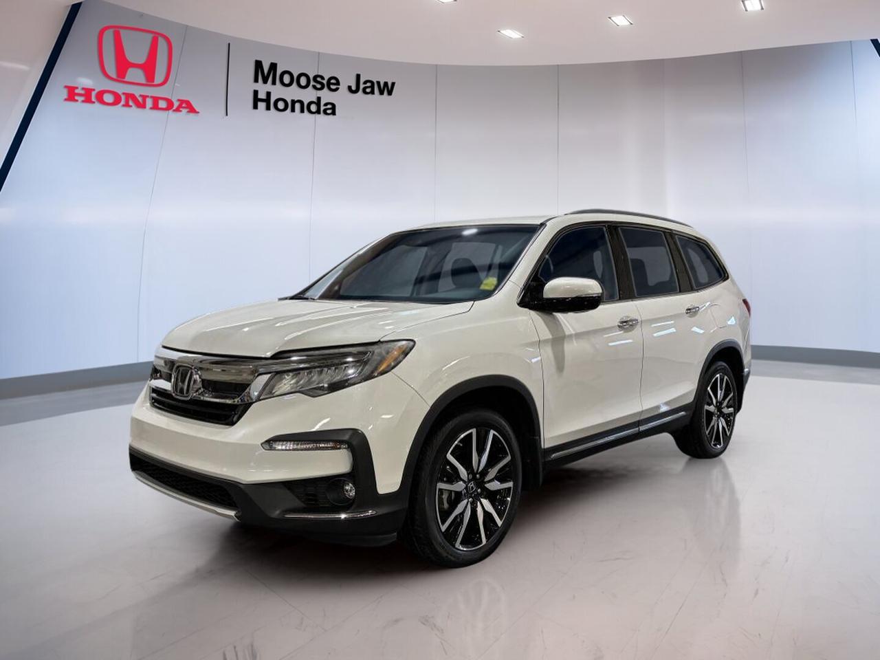 This 2020 Honda Pilot Touring 7-Passenger is a well-kept used SUV offered by Moose Jaw Honda in Moose Jaw. CARFAX Canada reports no accident, adding confidence to an already capable family vehicle. Finished in White with a Black interior, it blends a clean look with practical comfort. With 77,064 km, this Pilot Touring 7-Passenger is ready for daily driving, road trips, and busy family schedules.

Powered by a 3.5-litre V6 SOHC 24-valve i-VTEC engine with direct injection, this 2020 Honda Pilot Touring 7-Passenger delivers smooth power for highway merging, passing, and carrying passengers with ease. Its 9-speed automatic transmission supports refined performance, while all-wheel drive helps provide added control in changing prairie weather and on challenging road surfaces.

FEATURES OF THE Pilot Touring 7-Passenger

»» 3.5-litre V6 with direct injection
»» 9-speed automatic transmission included
»» All-wheel drive for added traction
»» Seven-passenger layout for family flexibility

ADVANCED SAFETY FEATURES

»» CARFAX Canada reports no accident
»» All-wheel drive supports confident traction
»» Stable handling in changing road conditions
»» Strong Honda engineering for family travel

PERFORMANCE AND EFFICIENCY

»» 3.5-litre V6 delivers smooth power
»» Direct injection supports responsive performance
»» 9-speed automatic shifts with refinement
»» All-wheel drive adds year-round confidence

COMFORT AND CONVENIENCE

»» Seven-passenger cabin suits active families
»» Black interior offers a clean look
»» Spacious SUV design supports daily comfort
»» Easy road-trip readiness for passengers

TECHNOLOGY AND CONNECTIVITY

»» Automatic transmission supports relaxed driving
»» Clear driver-focused layout for usability
»» Touring trim known for modern convenience
»» Practical controls for everyday operation

CARGO SPACE

»» SUV layout supports flexible cargo needs
»» Room for groceries and travel gear
»» Rear area suits family hauling
»» Cabin designed for passenger versatility

AWARDS & RECOGNITIONS

»» Top Safety Pick, Insurance Institute for Highway Safety, 2020
»» Best Buy Award, The Car Guide, 2020

WHAT OTHER OWNERS LIKE

»» Smooth V6 power for highway driving
»» Comfortable ride for family travel
»» Useful all-wheel drive in winter
»» Versatile cabin for passengers and cargo

This 2020 Honda Pilot Touring 7-Passenger offers the kind of versatility many Saskatchewan drivers want in a midsize SUV. Its proven V6 power, automatic transmission, and all-wheel drive setup make it a smart fit for commuting, school runs, and weekend escapes. The white exterior adds timeless appeal, while the black interior keeps the cabin looking neat and practical.

For shoppers seeking a used SUV with strong family value, trusted Honda engineering, and no accident history reported by CARFAX Canada, this 2020 Honda Pilot Touring 7-Passenger deserves a close look. It brings together space, confidence, and everyday usability in one capable package at Moose Jaw Honda.

This 2020 Honda Pilot Touring 7-Passengers VIN is: 5FNYF6H66LB503258.<p>This 2020 Honda Pilot Touring 7-Passenger is a well-kept used SUV offered by Moose Jaw Honda in Moose Jaw. CARFAX Canada reports no accident</p>
<p> and busy family schedules.

Powered by a 3.5-litre V6 SOHC 24-valve i-VTEC engine with direct injection</p>
<p> while all-wheel drive helps provide added control in changing prairie weather and on challenging road surfaces.

FEATURES OF THE Pilot Touring 7-Passenger

»» 3.5-litre V6 with direct injection
»» 9-speed automatic transmission included
»» All-wheel drive for added traction
»» Seven-passenger layout for family flexibility

ADVANCED SAFETY FEATURES

»» CARFAX Canada reports no accident
»» All-wheel drive supports confident traction
»» Stable handling in changing road conditions
»» Strong Honda engineering for family travel

PERFORMANCE AND EFFICIENCY

»» 3.5-litre V6 delivers smooth power
»» Direct injection supports responsive performance
»» 9-speed automatic shifts with refinement
»» All-wheel drive adds year-round confidence

COMFORT AND CONVENIENCE

»» Seven-passenger cabin suits active families
»» Black interior offers a clean look
»» Spacious SUV design supports daily comfort
»» Easy road-trip readiness for passengers

TECHNOLOGY AND CONNECTIVITY

»» Automatic transmission supports relaxed driving
»» Clear driver-focused layout for usability
»» Touring trim known for modern convenience
»» Practical controls for everyday operation

CARGO SPACE

»» SUV layout supports flexible cargo needs
»» Room for groceries and travel gear
»» Rear area suits family hauling
»» Cabin designed for passenger versatility

AWARDS & RECOGNITIONS

»» Top Safety Pick</p>
<p> 2020

WHAT OTHER OWNERS LIKE

»» Smooth V6 power for highway driving
»» Comfortable ride for family travel
»» Useful all-wheel drive in winter
»» Versatile cabin for passengers and cargo

This 2020 Honda Pilot Touring 7-Passenger offers the kind of versatility many Saskatchewan drivers want in a midsize SUV. Its proven V6 power</p>
<p> while the black interior keeps the cabin looking neat and practical.

For shoppers seeking a used SUV with strong family value</p>
<p> and everyday usability in one capable package at Moose Jaw Honda.

This 2020 Honda Pilot Touring 7-Passengers VIN is: 5FNYF6H66LB503258.</p>