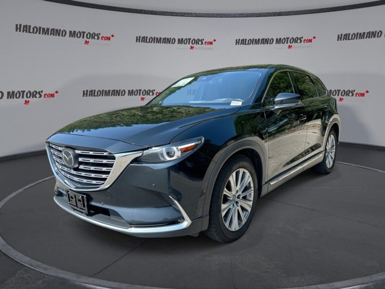 // ACCIDENT FREE!! //<br /><br />This 2021 Mazda CX-9 Signature AWD is a refined three-row SUV built for families who want comfort, confidence, and premium features every day. Finished in Black with a Brown interior, it blends upscale style with practical versatility for life in Cayuga and beyond.<br /><br />With 115,329 km, automatic transmission, and a responsive 2.5-litre gas engine, this used 2021 Mazda CX-9 Signature AWD delivers smooth power and composed road manners. Four doors, all-wheel drive confidence, and a well-equipped cabin make it a smart choice for daily driving and weekend travel.<br /><br />FEATURES OF THE CX-9 Signature AWD | No Accidents | Vent. Front Seats | 360 Camera<br />   Ventilated front seats add warm-weather comfort<br />   360-degree camera helps tight-space parking<br />   Head-up display keeps key data visible<br />   Navigation system supports easy trip planning<br /><br />ADVANCED SAFETY FEATURES<br />   Blind spot monitor supports safer lane changes<br />   Lane departure warning adds extra awareness<br />   Adaptive cruise control eases highway travel<br />   Backup camera improves reversing confidence daily<br /><br />PERFORMANCE AND EFFICIENCY<br />   2.5-litre gas engine balances power efficiently<br />   Automatic transmission delivers smooth gear changes<br />   All-wheel drive adds year-round road confidence<br />   Limited slip differential supports traction control<br /><br />COMFORT AND CONVENIENCE<br />   Ventilated front seats help summer comfort<br />   Heated front and rear seats included<br />   Dual-zone climate control keeps peace onboard<br />   Power liftgate adds easy cargo access<br /><br />TECHNONOLGY AND CONNECTIVITY<br />   Apple CarPlay connects favourite apps easily<br />   Android Auto adds simple smartphone integration<br />   Bluetooth integration supports hands-free communication<br />   Satellite radio expands in-cabin entertainment choices<br /><br />CARGO SPACE<br />   Three-row layout supports family hauling needs<br />   Power liftgate simplifies loading and unloading<br />   Rear cargo area suits errands well<br />   Flexible interior handles passengers and gear<br /><br />AWARDS & RECOGNITIONS<br />   Top Safety Pick, Insurance Institute for Highway Safety, 2021<br />   Best Family Midsize SUV, AutoTrader Canada, 2021<br /><br />WHAT OTHER OWNERS LIKE<br />   Smooth ride quality on long trips<br />   Quiet cabin with upscale interior feel<br />   Strong turbo power for daily driving<br />   Useful safety technology and camera views<br /><br />Inside, this 2021 Mazda CX-9 Signature AWD offers an inviting and premium environment with thoughtful details throughout. Heated front seats, heated rear seats, a heated steering wheel, memory seats, power front seats, lumbar support, ambient lighting, and dual-zone automatic climate control all help make every drive more enjoyable.<br /><br />Convenience is built into this 2021 Mazda CX-9 Signature AWD from every angle. Push-button start, power windows, power steering, retractable heated mirrors, automatic headlights, rear air conditioning, rear climate control, tinted windows, and a sunroof all work together to create a polished and easy ownership experience.<br /><br />Technology is another highlight in this 2021 Mazda CX-9 Signature AWD. You get a navigation system, head-up display, HD Radio, steering wheel audio controls, Apple CarPlay, Android Auto, Bluetooth integration, and a 360-degree camera system that helps you stay informed, connected, and confident on the road.<br /><br />Safety remains a major strength in this 2021 Mazda CX-9 Signature AWD. It comes equipped with anti-lock braking, stability control, driver and passenger airbags, side impact airbags, head side airbags, child safety locks, tire pressure monitoring, blind spot monitoring, lane departure warning, and adaptive cruise control.<br /><br />From its elegant Black exterior to its capable all-wheel drive system, this 2021 Mazda CX-9 Signature AWD brings together premium comfort, family-friendly space, and smart technology in one well-rounded SUV. It is a confident and versatile choice for drivers who want more from every kilometre.<br /><br />This 2021 Mazda CX-9 Signature AWD | No Accidents | Vent. Front Seats | 360 Cameras VIN is: JM3TCBEY8M0534245.<br /><br />WHY CHOOSE US? <br /><br />Honest & Transparent Buying Experience: Weve been a trusted name in business since 1984.<br /><br />STRAIGHTFORWARD PRICING:<br />Our Advertised Price Includes:<br />>>Safety Certification (No separate fee!)<br />>>30-Day 100% Mechanical Warranty<br />>>FREE Carfax History Report.<br />>>No upcharge for paying cash.<br />(Prices Exclude HST and Licensing Fees only.)<br /><br />>>Browse 300+ vehicles all in ONE LOCATION<br /><br />EASY FINANCING: Great rates & open loans<br /><br />WE BUY CARS: Get Top Dollar for your trade-in, or sell us your vehicle for CASH! Even if you dont buy from us!<br /><br />STOP BY TODAY<br />Treat yourself - stop by Haldimand Motors Ltd. located at 42 Talbot St E, Cayuga, ON N0A 1E0 to make this car yours today!<br /><br />https://www.haldimandmotors.com/used/stock-460832.html