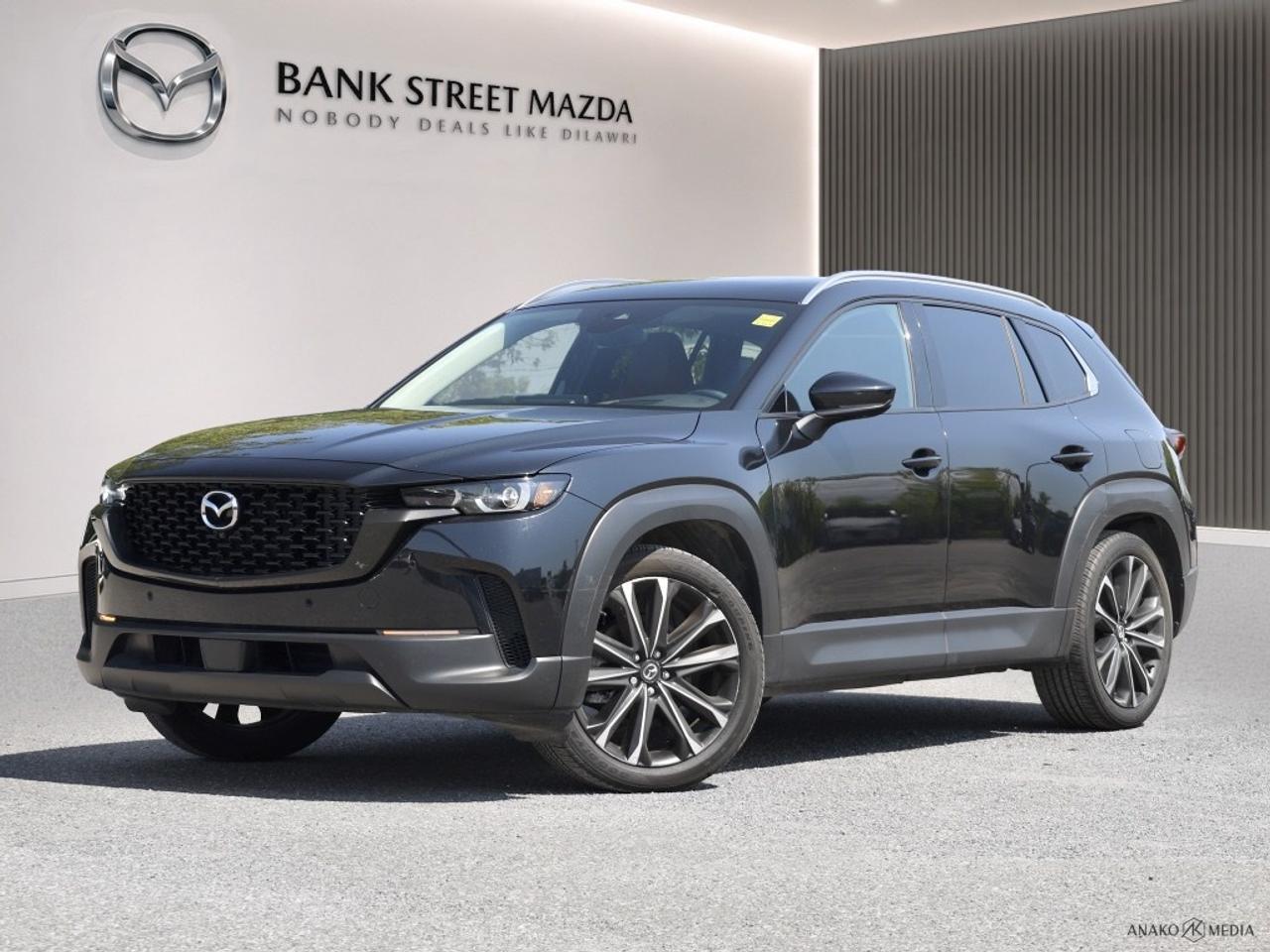 The 2024 Mazda CX-50 GT AWD in stunning black is a remarkable SUV offering unmatched style and exceptional handling with its all-wheel-drive capabilities. This vehicle is perfect for those who need reliable performance on all types of terrain. Step inside the luxurious interior featuring plush leather seats that ensure comfort for every journey. With features like a sunroof, a state-of-the-art navigation system, and keyless entry, every drive becomes an event. The exterior is complemented with stylish alloy wheels, adding to its commanding presence on the road. Stay fully connected and entertained with cutting-edge technology, including smart device integration and a heads-up display. Safety is paramount in the CX-50 GT AWD, boasting advanced features like lane assist, braking assist, adaptive cruise control, parking sensors, and a backup camera, all working harmoniously to provide peace of mind on every trip. This SUV is ideal for families and adventure seekers who demand both luxury and functionality. Contact Bank Street Mazda today to experience this extraordinary vehicle for yourself. Dont miss the chance to own a versatile and technologically packed Mazda guaranteed to elevate your driving experience.