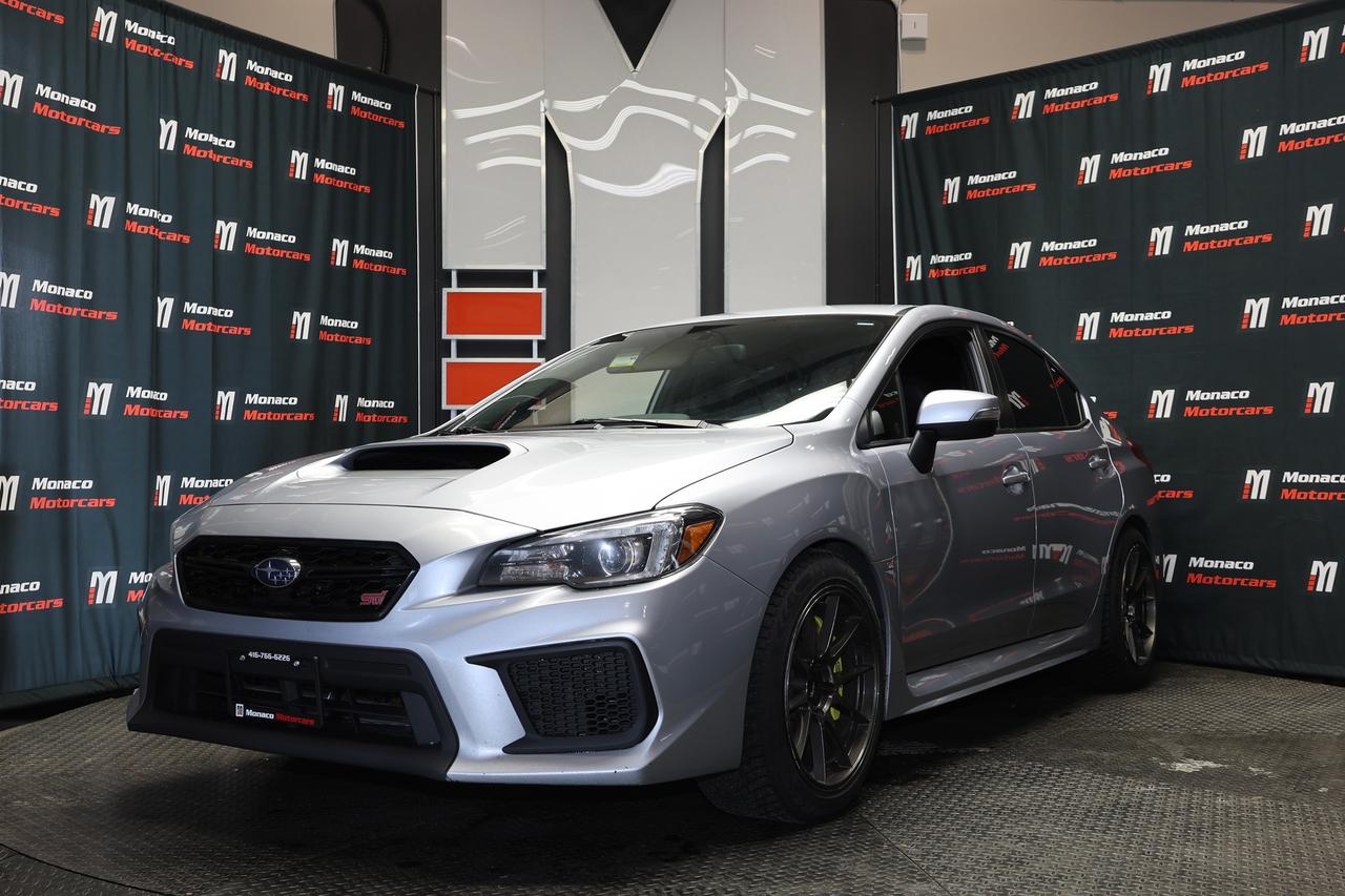 <p class=p1>Special Finance Price: $23,999 | Cash Price: $25,499</p><p class=p1>2019 Subaru WRX STi Manual - 6-Speed Manual, Fast FC Wheels, Backup Camera, Heated Seats, Alloy Wheels, Cruise Control, AUX, And Much More.</p><p class=p1>Odometer: 142,000 KM.</p><p class=p1>Call Us:&nbsp;(416) 766-6226</p><p class=p1>Monaco Motorcars Inc.</p><p class=p1>Location: 112 King St, Barrie</p><p class=p1>Business Hours:</p><p class=p1>Monday - Friday: 10am - 6pm</p><p class=p1>Saturday: 10am - 5pm</p><p class=p1>Sunday : Closed</p><p class=p1>www.monacomotorcars.com</p><p class=p1>Apply for Financing Online:&nbsp;www.monacomotorcars.com/financing/</p><p class=p1>All our vehicles go through an Ontario Standard Certification Inspection where we make sure the car is safe so you don&rsquo;t have to. An additional cost of $999 will be applied to all Certified vehicles. If not certified as per OMVIC regulations vehicle is not drivable, not certified and not e-tested. Each Certified vehicle comes with an Ontario Safety Certification and a 36-day or 2000 KM Safety Warranty. At Monaco Motorcars, we are revolutionizing the car buying experience. Come see the difference. Full vehicle history is disclosed prior to closing a deal because we want you to know everything about your next vehicle. Countless Financing options are available including $0 DOWN!!! (O.A.C.) All credit types welcome! Bad/Good/No Credit, bankruptcy, consumer proposal, new to Canada, student. Hassle-free approvals. No matter what your credit situation is, You Are Approved. Conditions apply. We Accept Trade-Ins! Bring it by for an Appraisal. Multiple extended warranty options are available to choose from.</p><p class=p1>We Are Proud To Serve Clients All Over Canada & Ontario - Toronto, Markham, Richmond Hill, Mississauga, Oshawa, Etobicoke, Newmarket, Pickering, Whitby, Ajax, North York, Scarborough, Barrie, Orangeville, Waterloo, Milton, Kitchener, Ottawa, Aurora, London, Kingston, Hamilton, Muskoka, Belleville, Brant, Brantford, Brockville, Cornwall, Windsor, Sudbury, Guelph, Orillia, Sarnia, Timmins, Thunder Bay, Welland, Pembroke, St Catharines, St. Thomas, Thorold, Ottawa, Owen Sound, Haldimand County, Kenora and Niagara Falls.</p><p class=p1>PRICES DISPLAYED: HST and licensing fees are not included.</p><p class=p1>FINANCING OPTIONS: Enjoy rates as low as 6.99% with $0 down and no payments for 3 months (O.A.C). Our expert financing team partners with major banks and lenders to secure the lowest rates and most flexible terms for your car loan. A $999 documentation fee applies.</p><p class=p1>We strive to provide accurate and up-to-date listing information; however, Monaco Motorcars is not responsible for any errors, omissions, or typographical mistakes. Prices are subject to change without notice. Please contact us to confirm details.</p>