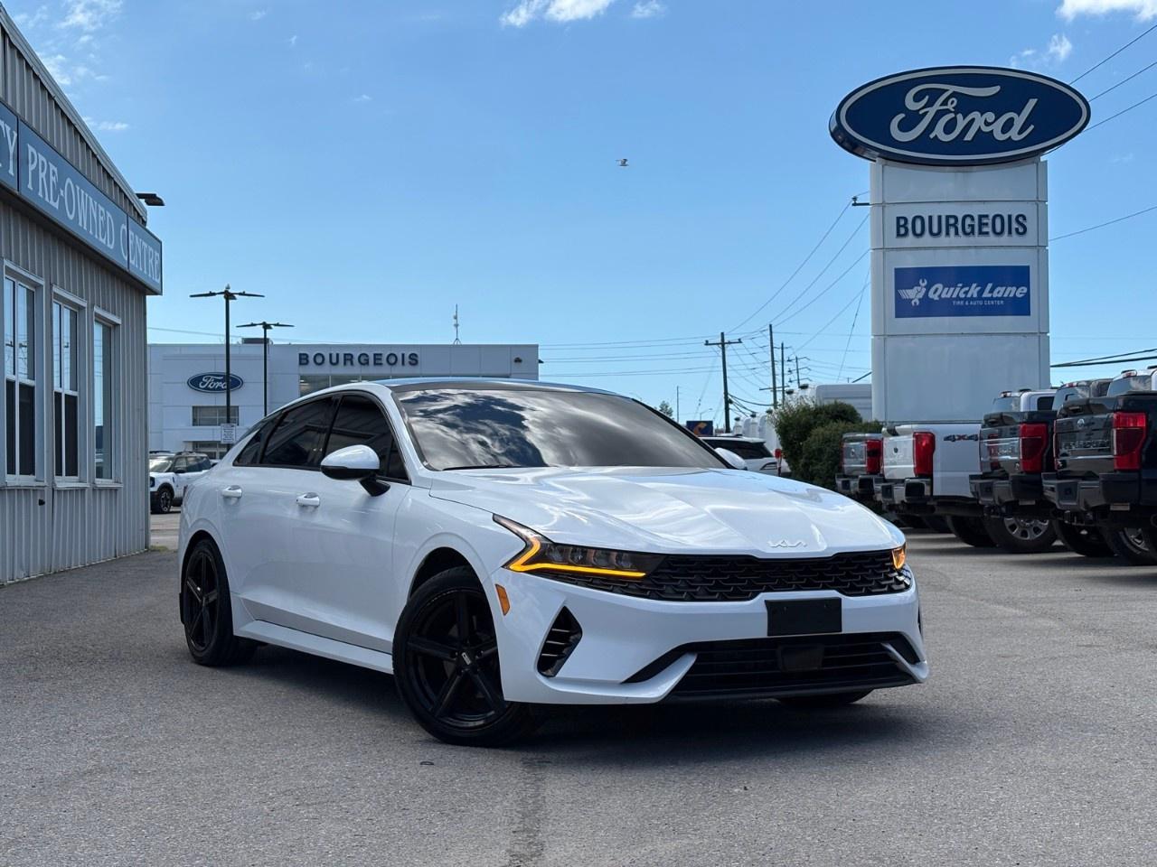 <p>Experience the elegance of the 2023 Kia K5 EX Auto AWD in a striking white finish. Its all-wheel drive system ensures superior handling on any road, giving you confidence in every journey.</p><p>The sophisticated design of this sedan is elevated by alloy wheels and a tasteful black interior. Enjoy the comfort of power seats, a leather steering wheel, and heated front seats for those cooler days. Additionally, the sunroof adds a touch of luxury, allowing natural light to fill the spacious cabin.</p><p>Stay connected and safe with smart device integration and Bluetooth connectivity. The K5 is equipped with a backup camera, parking sensors, lane assist, and adaptive cruise control, ensuring peace of mind. Keyless entry and remote start offer added convenience, while heated mirrors are a practical addition for Canadian winters.</p><p>Ideal for professionals and families alike, the Kia K5 is ready to elevate your driving experience. Contact Bourgeois Motors Ltd. today for more information and make this exceptional vehicle yours.</p> <p><strong>Why Choose the Bourgeois Auto Group?</strong></p><p>For 80 years, Bourgeois Auto Group has been delivering exceptional automotive experiences. Our factor trained teams work to ensure you receive the shopping experience you deserve; whether you're looking for a new or new-to-you vehicle.</p><p>Shop 24/7 with our online showroom and chat service, ensuring convenience every step of the way. No hidden fees, full disclosure, and every pre-owned vehicle comes with a Carfax® report for peace of mind.</p><p>We offer a wide selection of pre-owned vehicles, all competitively priced using real-time market data. Get the best deal on your purchase and trade-in with our free Live Market Analysis report.</p><p>Looking to sell your car? We buy any make or modelno purchase required. Our simple to use online trade valuation tool will provide you with a clear, transparent selling experience whether you buy our car or not.</p><p>Backed by hundreds dedicated employees across 4 convenient locations, were here to meet all your automotive needs. Visit us in Midland or Parry Sound and explore our inventory or schedule your next service today.</p> <p><strong>Financing Your Next Vehicle with Bourgeois Motors Ford in Midland:</strong></p><p>At Bourgeois Motors Ford, we make financing your next vehicle simple and stress-free! Our team works with trusted lenders to find flexible options tailored to your budget. Drive away with confidenceapply today!</p><p>Take advantage of our online pre-qualification tool, backed by Equifax and TD Bank to find the payment that works for you. Simply <a href=https://www.bourgeoismotors.com/free-credit-check/ rel=nofollow><strong>CLICK HERE</strong></a><strong> </strong>to use our secure online credit tool with no impact to your credit.</p>