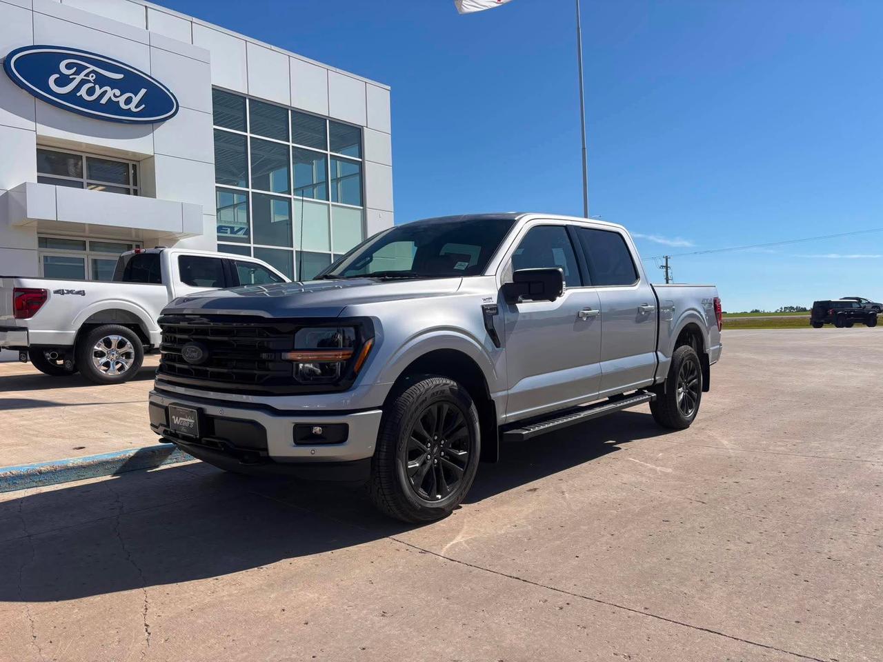 <p>Get ready to experience the pinnacle of capability and style with the brand new 2026 Ford F-150 XLT 4WD SuperCrew, now available at Webbs 1441. This isnt just a truck; its a statement. Dressed in a striking Iconic Silver Metallic finish and featuring the aggressive XLT Black Appearance Package Plus, this F-150 is built to turn heads whether youre navigating city streets or conquering rugged terrain. The SuperCrew cabin offers ample space for your crew and all their gear, ensuring comfort and convenience on every journey.</p><p>&nbsp;</p><p>Underneath its bold exterior lies a powerhouse ready for any challenge. The robust 5.0L V8 engine, paired with an Electronic 10-Speed Automatic transmission, delivers exhilarating performance and impressive towing prowess. Whether youre hauling equipment for work or embarking on a weekend adventure, this F-150 is engineered to exceed expectations. The 4-Wheel Drive system, coupled with the Electronic Locking 3.73 Axle Ratio, provides unwavering confidence and traction in all conditions, making it the ultimate partner for your demanding lifestyle.</p><p>&nbsp;</p><p>This 2026 Ford F-150 XLT is more than just a workhorse; its a sophisticated machine designed for the modern driver. From the sleek 20-inch gloss black painted aluminum wheels to the practical Bed Utility Package, every detail has been meticulously crafted for both form and function. Step inside the premium ActiveX trimmed 40/Console/40 front seat and discover a cabin that blends rugged durability with refined comfort, making every drive an enjoyable experience.</p><p>&nbsp;</p><p>Here are five features that truly make this 2026 Ford F-150 XLT stand out:</p><p><br><br></p><ul><li><strong>Powerful 5.0L V8 Engine:</strong> Unleash legendary Ford performance and torque for unmatched hauling and towing capability.</li></ul><p>&nbsp;</p><ul><li><strong>XLT Black Appearance Package Plus:</strong> Command attention with a menacing, all-black exterior aesthetic, including striking gloss black wheels and accents.</li></ul><p>&nbsp;</p><ul><li><strong>Electronic Locking 3.73 Axle Ratio:</strong> Conquer challenging off-road conditions and slippery surfaces with enhanced traction and control.</li></ul><p>&nbsp;</p><ul><li><strong>Bed Utility Package:</strong> Maximize your trucks functionality with integrated features designed to make loading, securing, and accessing your cargo a breeze.</li></ul><p>&nbsp;</p><ul><li><strong>Iconic Silver Metallic Paint:</strong> Make a bold statement with this sophisticated and eye-catching metallic finish that exudes premium quality.</li></ul><p><br><br></p><p><strong><em>Powered by AutoIntelligence&trade;</em></strong></p><p>&nbsp;</p><p>Powered by AutoIntelligence&trade;</p><p>&nbsp;</p>