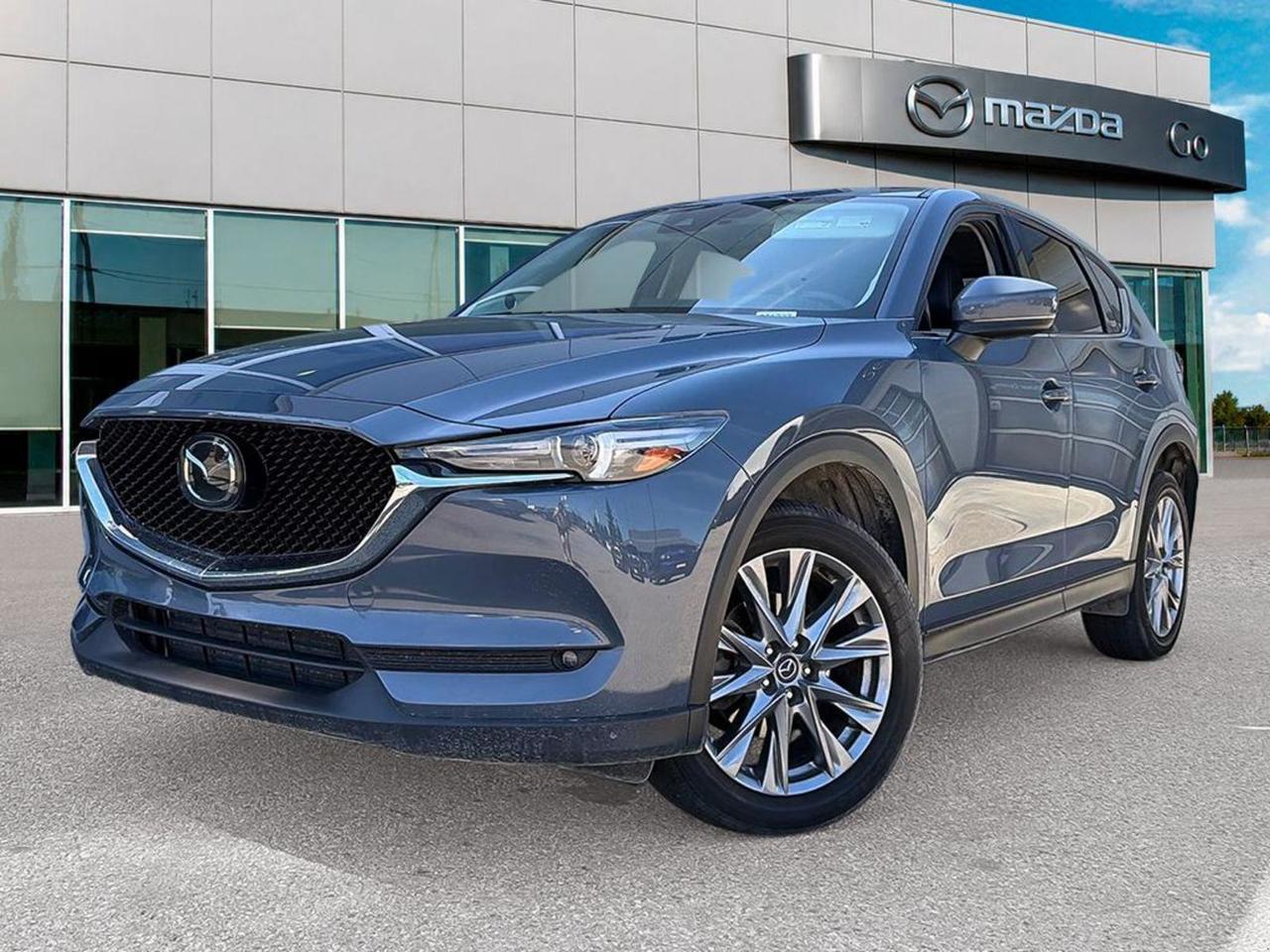 Discover the perfect blend of power, luxury, and advanced technology with this pre-owned 2021 Mazda CX-5 GT w/Turbo AWD in sleek Grey. Equipped with a spirited 2.5L SKYACTIV-G turbocharged engine paired with a smooth 6-speed automatic transmission, it delivers dynamic performance and confident handling with all-wheel drive.Step inside to experience premium comfort with heated and ventilated leather front seats, dual-zone automatic climate control, and a cutting-edge Bose premium sound system featuring navigation on an 8-inch touchscreen. Safety is comprehensive with lane departure prevention, blind spot monitoring, and forward collision mitigation, ensuring peace of mind on every drive.With stylish 19 alloy wheels, LED adaptive headlights, and a power liftgate, this CX-5 combines functionality and sophistication. Dont miss your chance to own a versatile, well-equipped SUV thats ready to elevate your driving experience.Schedule your test drive today at Go Mazda!Go Mazda is an AMVIC licenced buisnessThis vehicle has been registered in the province ofQuébec