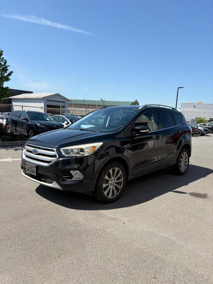 <p>Comfortable, capable, and loaded with premium features, this 2017 Ford Escape Titanium 4WD is an excellent choice for drivers looking for a well-equipped compact SUV with everyday practicality and confident all-weather capability. With 129,364 kms and a powerful yet efficient 2.0L 4-cylinder engine, this pre-owned Ford Escape delivers a refined driving experience thats ideal for commuting, road trips, and family adventures alike.</p><p>Equipped with intelligent 4WD capability, the Escape provides enhanced traction and stability in changing road conditions, making it a dependable SUV year-round. The responsive turbocharged engine offers strong acceleration while maintaining solid fuel efficiency for daily driving. Its sleek exterior styling is paired with upscale Titanium trim details, giving this used Ford Escape a premium look and feel.</p><p>Inside, the cabin is designed for comfort and convenience with leather-trimmed seating, heated front seats, a 10-way power drivers seat, and dual-zone climate control to keep everyone comfortable in every season. Ambient interior lighting creates a refined atmosphere, while the hands-free foot-activated power liftgate adds convenience when loading cargo or groceries.</p><p>Technology is another standout feature in this quality inspected vehicle. Fords SYNC 3 infotainment system with an 8-inch touchscreen offers seamless access to Apple CarPlay and Android Auto, while the premium 10-speaker Sony audio system delivers impressive sound quality throughout the cabin. Push-button start and remote start further enhance everyday convenience.</p><p>Safety is also well covered with Blind Spot Information System and Rear Cross Traffic Alert, helping provide added confidence and awareness behind the wheel.</p><p>This vehicle has undergone a professional inspection and reconditioning process at our Kia dealership, ensuring high standards for reliability, quality, and long-term ownership value.</p><p>If youre searching for a stylish and feature-packed used SUV with premium comfort and advanced technology, this 2017 Ford Escape Titanium 4WD is ready for your next drive.</p><p>Key Features Include:</p><p>· 4WD capability</p><p>· 2.0L 4-cylinder engine</p><p>· Leather-trimmed seats</p><p>· Heated front seats</p><p>· 10-way power drivers seat</p><p>· Ambient interior lighting</p><p>· SYNC 3 infotainment system</p><p>· 8-inch touchscreen display</p><p>· Apple CarPlay and Android Auto</p><p>· Premium 10-speaker Sony audio system</p><p>· Hands-free foot-activated power liftgate</p><p>· Push-button start</p><p>· Remote start</p><p>· Dual-zone climate control</p><p>· Blind Spot Information System</p><p>· Rear Cross Traffic Alert</p><p>Write ups are completed by ChatGPT. The Information generated by ChatGPT is based on machine learning algorithms and natural language processing technology. It may not always be accurate and should be verified through additional sources.</p>