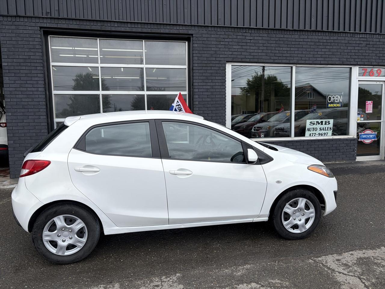 <p>Looking for a reliable and fun-to-drive compact car that wont break the bank? SMB Auto Sales has the perfect solution for you with this spirited 2012 Mazda MAZDA2 SPORT. This agile wagon is ideal for navigating city streets or embarking on weekend adventures, offering a surprisingly spacious interior for its class and a driving experience thats always engaging. With its front-wheel drive and automatic transmission, it provides a smooth and effortless ride, making every commute a pleasure.</p>
<p>This 2012 Mazda MAZDA2 SPORT comes equipped with a host of features designed to enhance your comfort, convenience, and safety. Youll appreciate the ease of remote keyless entry and power accessories, while the air conditioning ensures a comfortable cabin no matter the weather. For peace of mind, it includes essential safety features like traction control, anti-lock brakes, and multiple airbags. Plus, with a rear window wiper and defrost, youll always have clear visibility. This particular MAZDA2 SPORT has seen 241,000 kilometers of reliable service and is ready for its next chapter.</p>
<p>Here are five features that truly make this 2012 Mazda MAZDA2 SPORT stand out:</p>
<ul>
<li><strong>Remote / Keyless Entry:</strong> Say goodbye to fumbling for keys in the dark or rain. Effortlessly unlock your doors and hop in with this convenient feature.</li>
<li><strong>Traction Control & Vehicle Stability Management (VSM):</strong> Drive with confidence in various conditions. These advanced systems work together to help you maintain control and stability, especially during sudden maneuvers or on slippery surfaces.</li>
<li><strong>Anti-lock Brakes / ABS & Assisted Braking:</strong> Stop with precision and control. ABS prevents wheel lock-up during hard braking, while assisted braking provides extra stopping power when you need it most, enhancing your safety.</li>
<li><strong>Power Windows & Power Door Locks:</strong> Enjoy effortless operation of your windows and doors, adding a touch of modern convenience to your daily drive.</li>
<li><strong>Rear Window Wiper & Rear Defrost:</strong> Never let poor visibility hinder your journey. These features ensure a clear view out the back, even in inclement weather, keeping you safe and aware.</li>
</ul>
<p><strong><em>Powered by AutoIntelligence™</em></strong></p>
<p>Vehicle information has been generated using artificial intelligence and is provided for informational purposes only. While efforts are made to ensure accuracy, please confirm all details directly with the dealer.</p>
