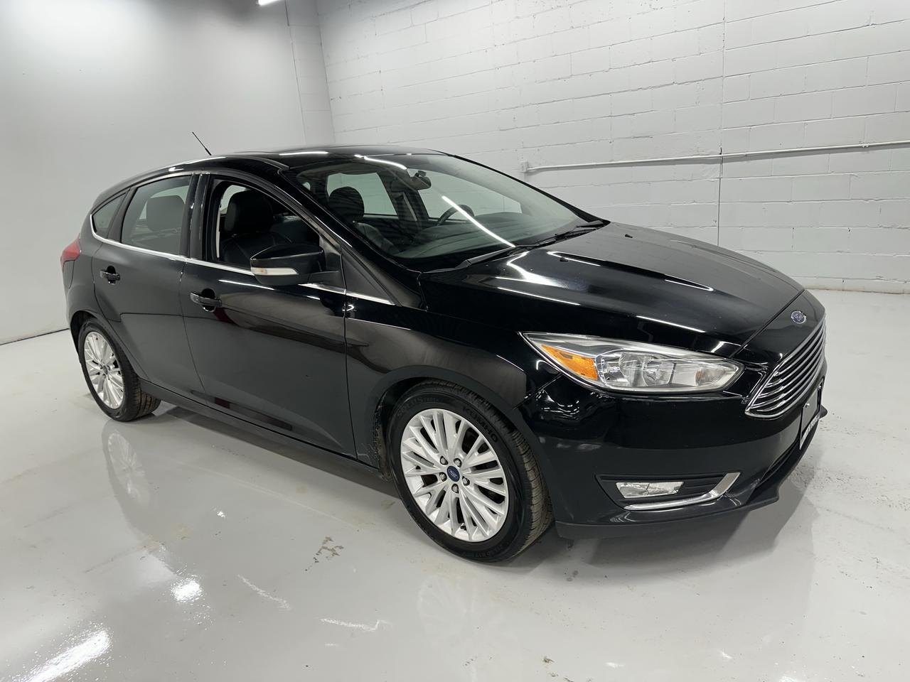 <p>Looking for a stylish and feature-packed ride that wont break the bank? Troys Toys has just what you need with this sleek, pre-owned 2018 Ford Focus Titanium Hatch in a classic black exterior and matching black interior. This isnt just any hatchback; the Titanium trim means youre getting a premium experience, loaded with the technology and comfort youd expect from a higher-end vehicle. With its versatile 4-door hatchback design, its perfect for everything from daily commutes to weekend adventures, offering practicality without sacrificing an ounce of style.</p><p>Under the hood, youll find a capable 2.0L I4 engine paired with a smooth automatic transmission, delivering efficient and responsive performance for all your driving needs. And with front-wheel drive, you can count on reliable handling and stability on Canadian roads. This Focus has seen its fair share of adventures, with 164,196 km on the odometer, proving its been a trusted companion for its previous owner and is ready for many more miles with you.</p><p>This 2018 Ford Focus Titanium Hatch is brimming with features designed to enhance your driving pleasure. At Troys Toys, we know what buyers are looking for, and this vehicle delivers. Get ready to experience a blend of performance, comfort, and advanced technology that makes every drive a joy.</p><p>Here are 5 sizzling features of this 2018 Ford Focus Titanium Hatch:</p><ul><li><strong>Titanium Trim Excellence:</strong> Experience premium comfort and advanced features that elevate your driving experience beyond the ordinary.</li><li><strong>Versatile Hatchback Design:</strong> Enjoy the flexibility of ample cargo space and easy loading, perfect for hauling groceries, gear, or weekend getaways.</li><li><strong>Smooth Automatic Transmission:</strong> Effortlessly navigate city streets and highways with a responsive and seamless automatic gearbox.</li><li><strong>Sleek Black-on-Black Aesthetic:</strong> Turn heads with a sophisticated and timeless look, both inside and out, in a classic black finish.</li><li><strong>Flex Fuel Capability:</strong> Enjoy greater fuel flexibility and potential cost savings, adapting to available fuel options on the go.</li></ul><p><strong><em>Powered by AutoIntelligence&trade;</em></strong></p><p>Vehicle information has been generated using artificial intelligence and is provided for informational purposes only. While efforts are made to ensure accuracy, please confirm all details directly with the dealer.</p>