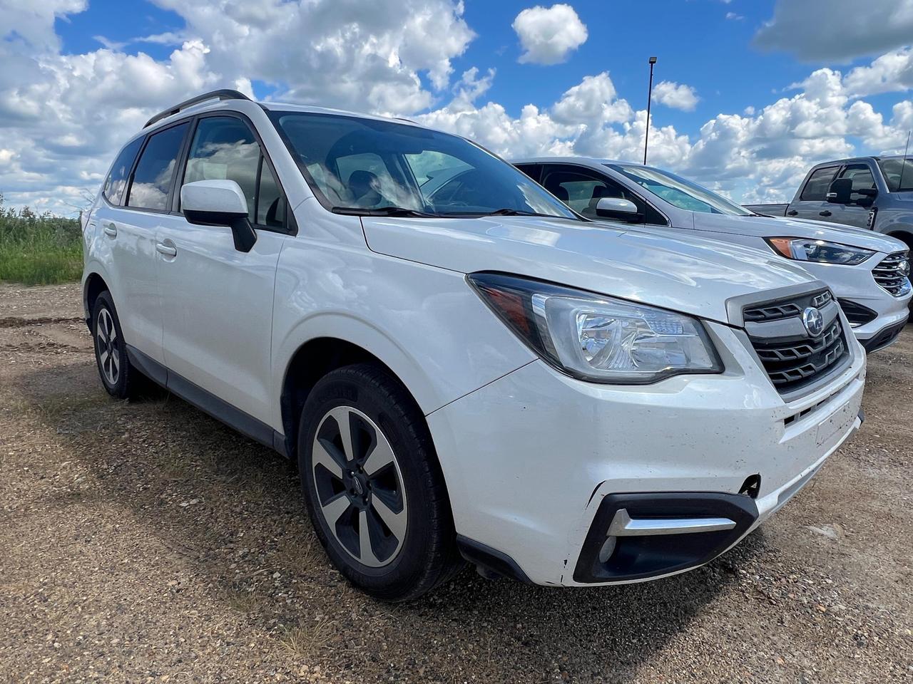 If youre looking for a dependable all-weather SUV that blends practicality with genuine comfort features, this 2018 Subaru Forester Touring is worth your full attention. With AWD capability, a panoramic sunroof, power-adjustable drivers seat, and dual-zone climate control, this trim level goes well beyond the base Forester experience  all at a used price point.

- Symmetrical All-Wheel Drive (AWD) for confident handling in Canadian winters and mixed road conditions
- Express Open/Close Panoramic Sliding Glass Sunroof with sunshade  a Touring exclusive feature
- 10-way power-adjustable drivers seat with power lumbar support for long-haul comfort
- Dual Zone Front Automatic Air Conditioning for personalized cabin temperature control
- EyeSight-grade safety suite including Rear Collision Warning, Blind Spot Detection, and Back-Up Camera
- 17 Aluminum Alloy wheels with Yokohama Geolandar all-season tires already equipped
- Fuel-efficient 2.5L 4-cylinder engine averaging 7.4 L/100km on the highway
- 80,000 km of use with plenty of reliable kilometres remaining on Subarus proven platform

Ready to take the next step? Visit Merit Ford Sales to book a test drive, ask us your questions, or get started on your purchase today. Our team is here to make the process straightforward and stress-free  reach out online or stop by in person.
