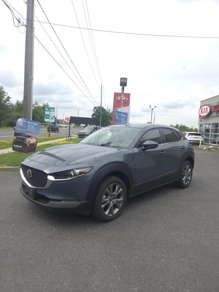 Discover a smart and refined compact SUV at Peterborough Kia with this used 2024 Mazda CX-30 GS AWD. Finished in Grey and showing just 9,100 km, it offers the confidence of all-wheel drive, the ease of an automatic transmission, and the premium feel that makes this model so popular in Canada.

The 2024 Mazda CX-30 GS AWD blends everyday practicality with a polished driving character. Its compact size is easy to manage in town, yet it still gives you the elevated seating position and versatility buyers want from an SUV. This well-kept example is ideal for commuting, family use, and weekend travel around Peterborough.

FEATURES OF THE CX-30 Gs Awd
»» Standard all-wheel drive for added confidence
»» Automatic transmission for smooth daily driving
»» Compact SUV shape with flexible utility
»» Low 9,100 km for added value

ADVANCED SAFETY FEATURES
»» Smart brake support helps avoid collisions
»» Lane departure warning adds driving confidence
»» Blind spot monitoring aids safer lane changes
»» Rear cross traffic alert helps reversing

PERFORMANCE AND EFFICIENCY
»» All-wheel drive supports year-round road grip
»» Automatic transmission delivers smooth acceleration
»» Responsive handling feels balanced and composed
»» Efficient design suits daily driving needs

COMFORT AND CONVENIENCE
»» Dual-zone climate control adds cabin comfort
»» Heated front seats help on cold mornings
»» Push-button start adds everyday convenience
»» Rear seat split expands passenger flexibility

TECHNOLOGY AND CONNECTIVITY
»» Apple CarPlay supports easy smartphone access
»» Android Auto keeps apps within reach
»» Bluetooth connectivity supports hands-free communication
»» Central display keeps key information visible

CARGO SPACE
»» Rear hatch opening simplifies cargo loading
»» Split rear seats increase storage flexibility
»» Flat load area helps carry gear
»» Compact exterior still offers useful room

AWARDS & RECOGNITIONS
»» Top Safety Pick, Insurance Institute for Highway Safety, 2024

WHAT OTHER OWNERS LIKE
»» Confident all-wheel drive in changing weather
»» Upscale cabin feel for the class
»» Smooth ride with agile city handling
»» Useful cargo space for daily errands

This used 2024 Mazda CX-30 GS AWD stands out with its low kilometres, practical size, and strong value. It is a great fit for drivers who want comfort, confidence, and quality in one well-rounded SUV. The Grey exterior gives it a clean and modern look that suits any driveway.

If you want a compact SUV that feels refined on the road and ready for Canadian weather, this 2024 Mazda CX-30 GS AWD is well worth your attention. Available now at Peterborough Kia in Peterborough, it is a smart choice for drivers who want a dependable and stylish used SUV.

This 2024 Mazda CX-30 Gs Awds VIN is: 3MVDMBCM7RM705712 .<p>Discover a smart and refined compact SUV at Peterborough Kia with this used 2024 Mazda CX-30 GS AWD. Finished in Grey and showing just 9</p>
<p> and the premium feel that makes this model so popular in Canada.

The 2024 Mazda CX-30 GS AWD blends everyday practicality with a polished driving character. Its compact size is easy to manage in town</p>
<p> yet it still gives you the elevated seating position and versatility buyers want from an SUV. This well-kept example is ideal for commuting</p>
<p> and weekend travel around Peterborough.

FEATURES OF THE CX-30 Gs Awd
»» Standard all-wheel drive for added confidence
»» Automatic transmission for smooth daily driving
»» Compact SUV shape with flexible utility
»» Low 9</p>
<p>100 km for added value

ADVANCED SAFETY FEATURES
»» Smart brake support helps avoid collisions
»» Lane departure warning adds driving confidence
»» Blind spot monitoring aids safer lane changes
»» Rear cross traffic alert helps reversing

PERFORMANCE AND EFFICIENCY
»» All-wheel drive supports year-round road grip
»» Automatic transmission delivers smooth acceleration
»» Responsive handling feels balanced and composed
»» Efficient design suits daily driving needs

COMFORT AND CONVENIENCE
»» Dual-zone climate control adds cabin comfort
»» Heated front seats help on cold mornings
»» Push-button start adds everyday convenience
»» Rear seat split expands passenger flexibility

TECHNOLOGY AND CONNECTIVITY
»» Apple CarPlay supports easy smartphone access
»» Android Auto keeps apps within reach
»» Bluetooth connectivity supports hands-free communication
»» Central display keeps key information visible

CARGO SPACE
»» Rear hatch opening simplifies cargo loading
»» Split rear seats increase storage flexibility
»» Flat load area helps carry gear
»» Compact exterior still offers useful room

AWARDS & RECOGNITIONS
»» Top Safety Pick</p>
<p> 2024

WHAT OTHER OWNERS LIKE
»» Confident all-wheel drive in changing weather
»» Upscale cabin feel for the class
»» Smooth ride with agile city handling
»» Useful cargo space for daily errands

This used 2024 Mazda CX-30 GS AWD stands out with its low kilometres</p>
<p> and quality in one well-rounded SUV. The Grey exterior gives it a clean and modern look that suits any driveway.

If you want a compact SUV that feels refined on the road and ready for Canadian weather</p>
<p> this 2024 Mazda CX-30 GS AWD is well worth your attention. Available now at Peterborough Kia in Peterborough</p>
<p> it is a smart choice for drivers who want a dependable and stylish used SUV.

This 2024 Mazda CX-30 Gs Awds VIN is: 3MVDMBCM7RM705712 .</p>