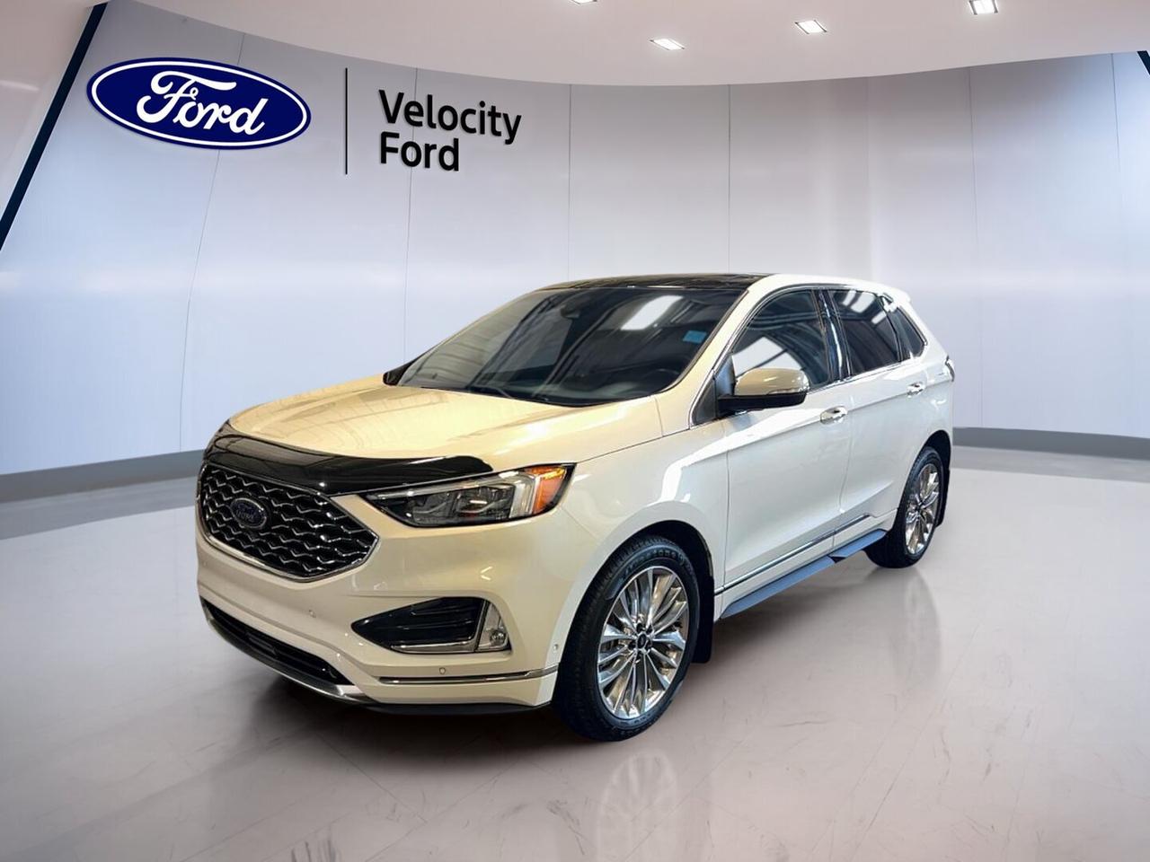 // ACCIDENT FREE!! //

This 2020 Ford Edge Titanium AWD is a well-equipped used SUV offered by Velocity Ford in Moose Jaw. CARFAX Canada reports no accident, giving you added peace of mind. With its White exterior, Black interior, 4-door layout, automatic transmission, and 2.0-litre unleaded engine, it delivers comfort, confidence, and everyday versatility.

With 107,464 km on the odometer, this 2020 Ford Edge Titanium AWD continues to offer the refined road manners and premium features many drivers want in a midsize SUV. It blends a quiet cabin, useful technology, and all-wheel drive capability, making it a smart fit for commuting, road trips, and changing Prairie weather.

FEATURES OF THE Edge Titanium AWD
»» 2.0-litre turbocharged four-cylinder engine
»» All-wheel drive for added traction
»» Power liftgate for easier loading
»» Heated front seats and remote starter

ADVANCED SAFETY FEATURES
»» Backup camera helps with reversing visibility
»» Blind spot monitor adds lane awareness
»» Lane departure warning supports safer travel
»» Side and head airbags enhance protection

PERFORMANCE AND EFFICIENCY
»» 2.0-litre unleaded engine balances power well
»» Eight-speed automatic supports smooth shifting
»» All-wheel drive improves year-round confidence
»» Stability control helps maintain composed handling

COMFORT AND CONVENIENCE
»» Dual-zone climate control boosts cabin comfort
»» Heated front seats help on cold mornings
»» Power seats include driver memory settings
»» Push button start adds daily ease

TECHNOLOGY AND CONNECTIVITY
»» Bluetooth integration supports hands-free calling
»» WiFi hotspot helps keep devices connected
»» Satellite radio expands entertainment choices
»» Steering wheel audio controls simplify access

CARGO SPACE
»» Rear trunk access makes loading convenient
»» Power liftgate adds everyday practicality
»» Four-door design supports passenger flexibility
»» Spacious SUV layout suits daily errands

AWARDS & RECOGNITIONS
»» Top Safety Pick, Insurance Institute for Highway Safety, 2020
»» Best 2-Row SUV for Families, U.S. News, 2020

WHAT OTHER OWNERS LIKE
»» Quiet ride quality on highways
»» Comfortable seating for longer drives
»» User-friendly infotainment and simple controls
»» Confident all-wheel drive in winter

This Ford Edge is equipped with many features drivers appreciate every day, including cruise control, power steering, anti-lock braking system, stability control, child safety locks, heated mirrors, power windows, fog lights, automatic headlights, LED headlamps, rear window defroster, and tinted windows for added comfort and convenience.

Inside, the cabin offers a premium feel with a leather-wrapped steering wheel, ambient lighting, automatic climate control, lumbar support for both front occupants, an auto-dimming rearview mirror, illuminated vanity mirrors, and memory mirrors. The result is a practical and comfortable space that works well for both solo driving and family use.

This SUV also includes useful convenience features such as remote starter, rear spoiler, tire pressure monitoring, turn signal mirrors, HD Radio, passenger airbag sensor, spare tire, performance tires, and dual shift mode transmission. Every drive benefits from a thoughtful mix of comfort, safety, and capability.

This 2020 Ford Edge Titanium AWDs VIN is: 2FMPK4K98LBA58593.
