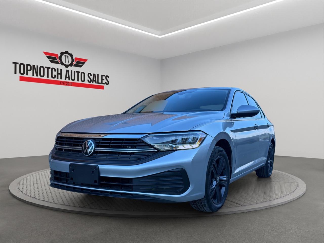 <h2>2023 Volkswagen Jetta  FWD | 1.5L Turbo | Automatic | Sedan</h2><p><br></p><p><strong>Available Now at Topnotch Auto Sales Inc</strong></p><p><br></p><p>Experience the perfect combination of refined German craftsmanship, advanced technology, and exceptional fuel efficiency with this <strong>2023 Volkswagen Jetta</strong>. Renowned for its smooth and composed ride, this Jetta delivers a premium driving experience that excels in both city commutes and highway journeys. Its outstanding reliability, upscale interior appointments, and innovative features make it an excellent choice for individuals and families alike seeking a sedan that stands out in style and substance.</p><p><br></p><p>This meticulously engineered compact sedan offers a harmonious blend of comfort, convenience, and practicality. The 2023 Jetta makes every drive enjoyable with its sleek design, state-of-the-art connectivity features, and a robust powertrain that ensures both spirited performance and cost-effective efficiency for todays discerning drivers.</p><p><br></p><p><br></p><p><br></p><h1>Key Vehicle Details</h1><p><br></p><p><strong>Make & Model:</strong> 2023 Volkswagen Jetta</p><p><br></p><p><strong>Body Style:</strong> Sedan</p><p><br></p><p><strong>Engine:</strong> 1.5L Turbocharged 4-cylinder gasoline engine</p><p><br></p><p><strong>Transmission:</strong> Automatic</p><p><br></p><p><strong>Drive Type:</strong> Front-Wheel Drive (FWD)</p><p><br></p><p><strong>VIN:</strong> {3VWEM7BU2PM058263}</p><p><br></p><p><br></p><h1>Performance & Efficiency</h1><p><br></p><p>Powering the Jetta is a dynamic <strong>1.5L turbocharged 4-cylinder engine</strong> seamlessly mated to an advanced automatic transmission. This combination delivers lively acceleration, smooth and responsive handling, and a quiet ride that amplifies your driving pleasure. The fuel-efficient engine ensures that you spend more time on the road and less time at the pump, making it perfect for daily driving and cross-country road trips alike.</p><p><br></p><p>Key performance highlights include:</p><p><br></p><ul><li><br></li><li>Responsive turbocharged power for everyday needs</li><li><br></li><li>Impressive fuel efficiency in both city and highway conditions</li><li><br></li><li>Stable highway cruising with minimal road noise</li><li><br></li><li>Front-wheel drive for enhanced control in various weather conditions</li><li><br></li></ul><p><br></p><p>Whether maneuvering through city traffic or cruising on the open highway, the Jetta is engineered for comfort and efficiency at every turn.</p><p><br></p><p><br></p><h1>Interior Comfort & Features</h1><p><br></p><p>Step inside to discover a thoughtfully crafted cabin that prioritizes comfort and sophistication. The interior is spacious, offering generous legroom and premium finishes throughout, making every journey relaxing for both driver and passengers. Designed with modern ergonomics in mind, the Jettas layout is intuitive and user-friendly.</p><p><br></p><p>Interior highlights include:</p><p><br></p><ul><li><br></li><li>Well-cushioned seating designed for support on long drives</li><li><br></li><li>Spacious layout comfortably seating up to five passengers</li><li><br></li><li>High-quality interior materials and elegant trim</li><li><br></li><li>Ample trunk capacity for all your cargo needs</li><li><br></li><li>Driver-centric controls for a personalized driving experience</li><li><br></li></ul><p><br></p><p>This combination of style and practicality creates the perfect space for busy lifestyles and weekend adventures alike.</p><p><br></p><p><br></p><h1>Technology & Connectivity</h1><p><br></p><p>The 2023 Volkswagen Jetta is equipped with cutting-edge technology to keep you connected, entertained, and informed wherever you go. Its infotainment system is intuitive and offers seamless integration of your devices for a truly modern driving experience.</p><p><br></p><p>Notable technology features include:</p><p><br></p><ul><li><br></li><li>Easy-to-use touchscreen infotainment display</li><li><br></li><li>Bluetooth® for hands-free calls and wireless audio streaming</li><li><br></li><li>Smartphone integration for Apple CarPlay and Android Auto compatibility</li><li><br></li><li>Convenient steering wheel-mounted audio and communication controls</li><li><br></li><li>Multiple USB ports and auxiliary inputs for all your devices</li><li><br></li></ul><p><br></p><p>Stay connected and in control whether youre heading to work or embarking on your next adventure.</p><p><br></p><p><br></p><h1>Safety & Driver Assistance</h1><p><br></p><p>Your safety is paramount in the 2023 Jetta, which is equipped with a wide array of active and passive safety features designed to provide peace of mind on every drive. These sophisticated systems are engineered to protect you and your passengers in any situation.</p><p><br></p><p>Safety amenities may include:</p><p><br></p><ul><li><br></li><li>Rearview camera for hassle-free reversing and parking</li><li><br></li><li>Anti-lock Braking System (ABS) for improved control</li><li><br></li><li>Electronic Stability Control for increased traction</li><li><br></li><li>Traction Control System (TCS) for enhanced grip</li><li><br></li><li>Advanced airbag system throughout the cabin</li><li><br></li><li>Tire Pressure Monitoring System (TPMS) for real-time alerts</li><li><br></li></ul><p><br></p><p>These comprehensive safety features ensure confidence behind the wheel, no matter where the road takes you.</p><p><br></p><p><br></p><h1>Exterior Styling</h1><p><br></p><p>The 2023 Volkswagen Jetta exudes modern elegance and sporty appeal. Its sculpted lines, aerodynamic silhouette, and refined details create a dynamic visual presence that turns heads wherever you go.</p><p><br></p><p>Exterior features include:</p><p><br></p><ul><li><br></li><li>Sharp, aerodynamic body contours for improved efficiency and style</li><li><br></li><li>Signature front grille and modern LED lighting accents</li><li><br></li><li>Attractive alloy wheels that complement the sedans profile</li><li><br></li><li>Sleek, sporty stance for a confident presence on the road</li><li><br></li><li>Distinctive styling that blends professionalism with a hint of sportiness</li><li><br></li></ul><p><br></p><p>This Jetta perfectly balances timeless sophistication with contemporary design.</p><p><br></p><p><br></p><h1>Vehicle Condition</h1><p><br></p><p>This <strong>2023 Volkswagen Jetta</strong> is in <strong>excellent condition</strong>, both inside and out. The meticulously maintained interior and exterior reflect pride of ownership and a commitment to quality. Benefit from the latest design and trusted German engineering for years of reliable service ahead.</p><p><br></p><p><br></p><h1>Why Choose Topnotch Auto Sales Inc?</h1><p><br></p><p>At <strong>Topnotch Auto Sales Inc</strong>, were committed to delivering outstanding value and a stress-free, transparent buying process. Our friendly and knowledgeable team is dedicated to helping you find the perfect vehicle and providing guidance throughout your purchasing journey.</p><p><br></p><p><br></p><h1>Flexible Financing Options</h1><p><br></p><p>We offer a range of financing solutions tailored to your needs, including options for:</p><p><br></p><ul><li><br></li><li>Good credit</li><li><br></li><li>Bad credit</li><li><br></li><li>No credit</li><li><br></li><li>Newcomers to Canada</li><li><br></li></ul><p><br></p><p>Enjoy quick approvals, low down payment options, and same-day financing so you can drive away in your new Jetta without delay.</p><p><br></p><p><br></p><h1>Certification & OMVIC Compliance</h1><p><br></p><p>For added confidence, this vehicle can be <strong>certified to meet Ontario Safety Standards</strong> for a nominal fee. In accordance with <strong>Ontario Motor Vehicle Industry Council (OMVIC)</strong> regulations, vehicles sold <strong>uncertified</strong> are offered <strong>as-is</strong> and must be certified prior to road registration in Ontario. Our knowledgeable staff will guide you through the certification process and answer all your questions, ensuring a seamless experience.</p><p><br></p><p><br></p><p><br></p><p><br></p><p> <strong>Visit Us At</strong></p><p><br></p><p>5455 Steeles Ave W</p><p><br></p><p>North York, ON M9L 1S7</p><p><br></p><p> <strong>Call or Text</strong></p><p><br></p><p>416-879-7113</p>