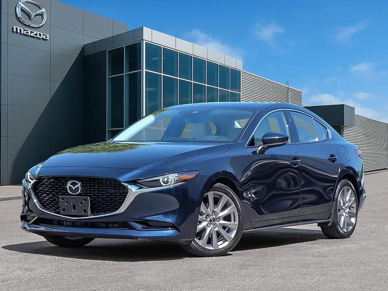 <p>Step into the world of elegance with the new 2026 Mazda Mazda3 GT FWD, dressed in a striking Deep Crystal Blue Mica. With its responsive front-wheel drive and seamless automatic transmission, this sedan promises smooth and confident handling.</p><p>The exterior of the Mazda3 effortlessly captures attention with its alloy wheels and a sophisticated silhouette. Inside, the black leather seats and thoughtful interior trim exude sophistication, complemented by the integration of a leather-wrapped steering wheel and gear shifter. The spacious cabin ensures a premium driving experience with features such as power seats and windows, adding comfort to your journeys.</p><p>The Mazda3 GT is packed with innovative technology designed to keep you connected and safe. Engage with the easy-to-use navigation system and stay entertained through its Bluetooth connection and satellite radio. Safety is a priority, equipped with a backup camera, lane assist, parking sensors, and powerful brake assist, ensuring peace of mind on every drive. The heads-up display and adaptive cruise control enhance your commute, while the heated mirrors and heated front seats add extra comfort during colder days.</p><p>For those who appreciate style, technology, and efficiency, this Mazda3 GT caters perfectly to your needs. Contact Cobourg Mazda today to explore more about this extraordinary vehicle, or schedule a test drive to experience it first-hand.</p>