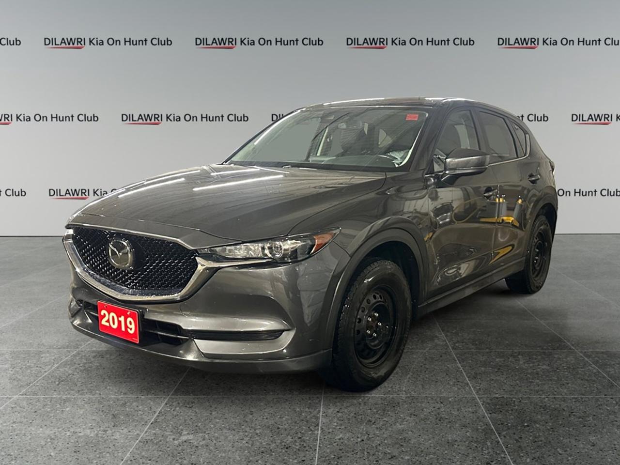 The 2019 Mazda CX-5 GS in a striking black finish with a front-wheel-drive system perfectly balances performance and handling, making it an ideal choice for both city driving and highway cruising. Its refined exterior is complemented by elegant alloy wheels and a practical SUV body style. Step inside to experience the comfort of heated seats, surrounded by a thoughtfully designed interior featuring leatherette door trim and a leather steering wheel, providing an elevated driving experience. This Mazda CX-5 GS is equipped with advanced technology, including seamless smartphone integration and a convenient backup camera. Safety is prioritized with lane assist and brake assist, ensuring peace of mind on every journey. Adaptive cruise control and keyless entry add to the suite of driver assistance features, guaranteeing a relaxed drive. Perfect for individuals or families seeking a reliable and stylish SUV, the Mazda CX-5 GS offers practicality without sacrificing sophistication. Contact Kia On Hunt Club today to learn more and arrange a test drive.