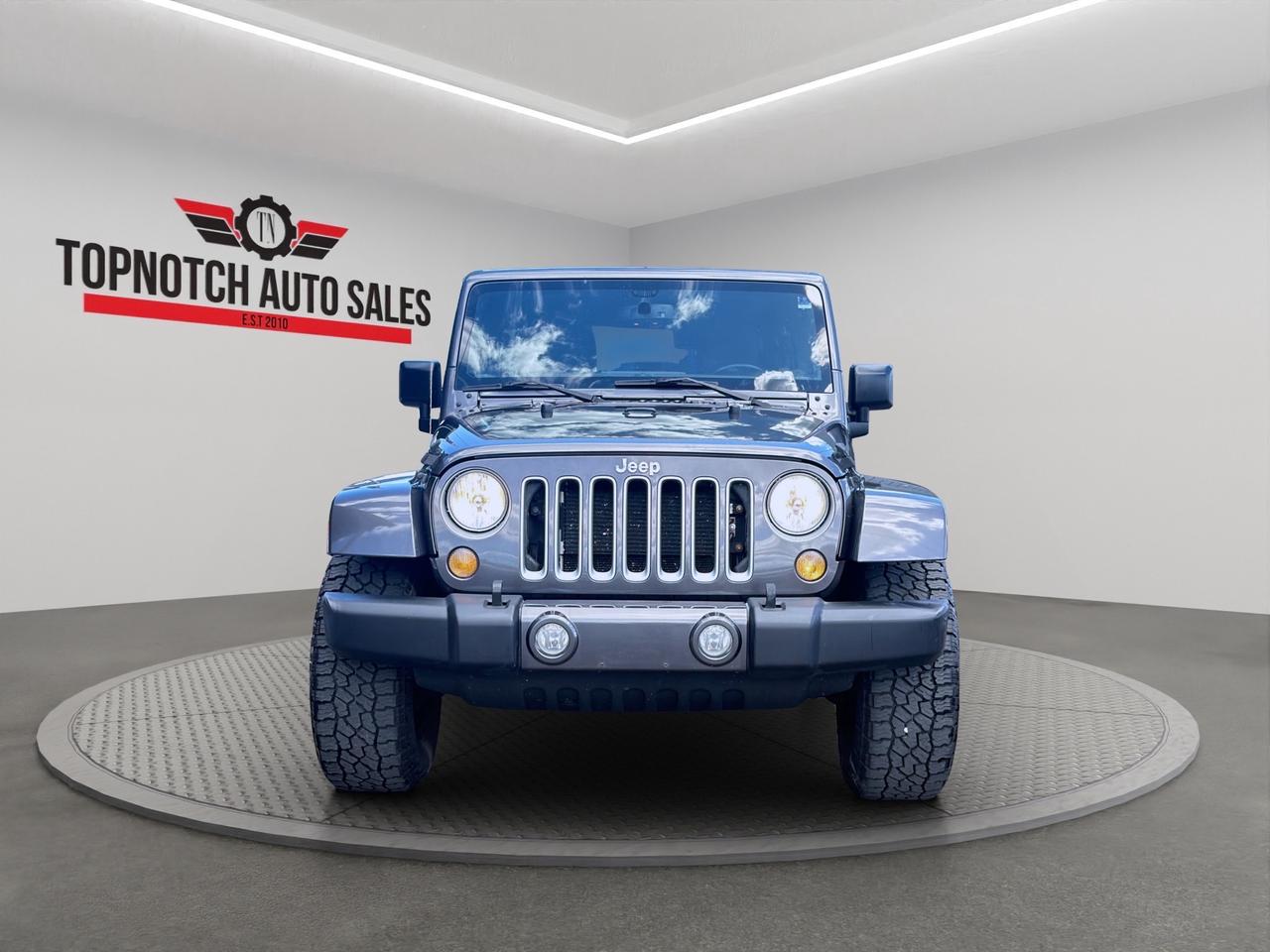 <h2 data-section-id=1j6nd8y data-start=0 data-end=44 class=PDq2pG_selectionAnchorContainer>2017 Jeep Wrangler Unlimited Sahara 4x4</h2><h3 data-section-id=1xdb1gq data-start=45 data-end=89>Now Available at Topnotch Auto Sales Inc</h3><p data-start=91 data-end=548>Experience legendary off-road capability, iconic styling, and open-air freedom with the 2017 Jeep Wrangler Unlimited Sahara 4x4. Built for adventure while still offering everyday comfort and practicality, this rugged SUV is ready to tackle city streets, highways, trails, and harsh Canadian winters with confidence. Whether youre exploring the outdoors or commuting daily, the Wrangler Sahara delivers unmatched versatility and unmistakable Jeep character.</p><hr data-start=550 data-end=553><h2 data-section-id=1okm08h data-start=555 data-end=591>Performance & Off-Road Capability</h2><p data-start=593 data-end=742>Powered by a proven and reliable V6 engine, the 2017 Jeep Wrangler Unlimited Sahara combines strong performance with exceptional off-road capability.</p><h3 data-section-id=o3tx9j data-start=744 data-end=771>Performance Highlights:</h3><ul data-start=773 data-end=1030><li data-section-id=fxxvbt data-start=773 data-end=810>Powerful and dependable V6 engine</li><li data-section-id=1mehwwx data-start=811 data-end=844>Smooth automatic transmission</li><li data-section-id=127tm4x data-start=845 data-end=878>Legendary Jeep 4x4 capability</li><li data-section-id=3mbaqy data-start=879 data-end=928>Heavy-duty suspension for off-road confidence</li><li data-section-id=1ygricq data-start=929 data-end=972>Excellent ground clearance and traction</li><li data-section-id=2jrct4 data-start=973 data-end=1030>Removable roof and doors for open-air driving freedom</li></ul><p data-start=1032 data-end=1122>From rugged trails to snowy roads, the Wrangler Sahara is built to handle every adventure.</p><hr data-start=1124 data-end=1127><h2 data-section-id=1vmgwka data-start=1129 data-end=1159>Interior Comfort & Features</h2><p data-start=1161 data-end=1274>Inside, the Wrangler Unlimited Sahara offers a spacious and practical cabin designed for comfort and versatility.</p><h3 data-section-id=1kyfc3b data-start=1276 data-end=1306>Interior Features Include:</h3><ul data-start=1308 data-end=1621><li data-section-id=h2cgui data-start=1308 data-end=1342>Premium cloth seating surfaces</li><li data-section-id=13a96ao data-start=1343 data-end=1365>Heated front seats</li><li data-section-id=12qyav9 data-start=1366 data-end=1400>Leather-wrapped steering wheel</li><li data-section-id=1607rrh data-start=1401 data-end=1433>Power windows and door locks</li><li data-section-id=14vdmqn data-start=1434 data-end=1475>Air conditioning with climate control</li><li data-section-id=bcjiiy data-start=1476 data-end=1516>Spacious rear seating and cargo area</li><li data-section-id=1w0jb1l data-start=1517 data-end=1576>Fold-flat rear seats for additional storage flexibility</li><li data-section-id=1aef09u data-start=1577 data-end=1621>Removable top for a true Jeep experience</li></ul><p data-start=1623 data-end=1710>The Wranglers interior balances rugged durability with modern comfort and convenience.</p><hr data-start=1712 data-end=1715><h2 data-section-id=b3uzc0 data-start=1717 data-end=1745>Technology & Connectivity</h2><p data-start=1747 data-end=1812>Stay connected and entertained wherever your adventures take you.</p><h3 data-section-id=ueknz1 data-start=1814 data-end=1838>Technology Features:</h3><ul data-start=1840 data-end=2091><li data-section-id=nl8zfu data-start=1840 data-end=1875>Touchscreen infotainment system</li><li data-section-id=1jkqg6s data-start=1876 data-end=1928>Bluetooth hands-free calling and audio streaming</li><li data-section-id=yklg1s data-start=1929 data-end=1953>Premium audio system</li><li data-section-id=g4yiug data-start=1954 data-end=1988>USB and auxiliary connectivity</li><li data-section-id=1kmrbs0 data-start=1989 data-end=2030>Steering-wheel-mounted audio controls</li><li data-section-id=ijhmlc data-start=2031 data-end=2066>Navigation system (if equipped)</li><li data-section-id=1rdbxk6 data-start=2067 data-end=2091>Remote keyless entry</li></ul><p data-start=2093 data-end=2170>Enjoy convenient technology features while staying focused on the road ahead.</p><hr data-start=2172 data-end=2175><h2 data-section-id=19h44cn data-start=2177 data-end=2206>Safety & Driver Assistance</h2><p data-start=2208 data-end=2335>Drive with confidence knowing the 2017 Jeep Wrangler Unlimited Sahara is equipped with important safety and stability features.</p><h3 data-section-id=1t7nrrv data-start=2337 data-end=2365>Safety Features Include:</h3><ul data-start=2367 data-end=2589><li data-section-id=1famp3c data-start=2367 data-end=2399>Electronic stability control</li><li data-section-id=umn5v6 data-start=2400 data-end=2434>Anti-lock braking system (ABS)</li><li data-section-id=rpadwm data-start=2435 data-end=2456>Hill start assist</li><li data-section-id=1uq12wi data-start=2457 data-end=2484>Traction control system</li><li data-section-id=fhas5y data-start=2485 data-end=2516>Advanced multistage airbags</li><li data-section-id=mtb5pq data-start=2517 data-end=2552>Tire pressure monitoring system</li><li data-section-id=uhg16f data-start=2553 data-end=2589>Strong reinforced body structure</li></ul><p data-start=2591 data-end=2634>Built for both adventure and peace of mind.</p><hr data-start=2636 data-end=2639><h2 data-section-id=1ppz69a data-start=2641 data-end=2661>Vehicle Condition</h2><p data-start=2663 data-end=2870>This Jeep Wrangler Unlimited Sahara 4x4 is presented in clean condition inside and out, showing pride of ownership and careful maintenance. Non-smoking and well cared for, it is ready for its next adventure.</p><hr data-start=2872 data-end=2875><h1 data-section-id=1ahblxa data-start=2877 data-end=2951>Topnotch Auto Sales  Your Trusted Source for Quality Pre-Owned Vehicles</h1><p data-start=2953 data-end=3114>At Topnotch Auto Sales Inc, we are committed to offering quality vehicles, exceptional customer service, and flexible financing solutions tailored to your needs.</p><hr data-start=3116 data-end=3119><h2 data-section-id=veflzl data-start=3121 data-end=3143>Financing Available</h2><p data-start=3145 data-end=3180>We work with all credit situations:</p><ul data-start=3182 data-end=3262><li data-section-id=wmona data-start=3182 data-end=3197>Good Credit</li><li data-section-id=8ftfia data-start=3198 data-end=3212>Bad Credit</li><li data-section-id=1yg6e4k data-start=3213 data-end=3226>No Credit</li><li data-section-id=1sz2mcn data-start=3227 data-end=3244>New to Canada</li><li data-section-id=s9znkq data-start=3245 data-end=3262>Self-Employed</li></ul><p data-start=3264 data-end=3318>Fast approvals and low down payment options available.</p><hr data-start=3320 data-end=3323><h2 data-section-id=1j0tog4 data-start=3325 data-end=3351>Certification Available</h2><p data-start=3353 data-end=3482>Vehicle can be certified for only <strong data-start=3387 data-end=3395>$799</strong>.<br data-start=3396 data-end=3399>Certification includes a comprehensive safety inspection to meet Ontario standards.</p><hr data-start=3484 data-end=3487><h2 data-section-id=27ho6s data-start=3489 data-end=3508>OMVIC Disclosure</h2><p data-start=3510 data-end=3678>As per OMVIC regulations, this vehicle is currently being sold <strong data-start=3573 data-end=3582>as<span id=jodit-selection_marker_1782322948432_7182777881575739 data-jodit-selection_marker=start style=line-height: 0; display: none;></span>is</strong> and is not certified unless otherwise stated. Certification is available at an additional cost.</p><hr data-start=3680 data-end=3683><p data-start=3685 data-end=3838>With over 14 years of experience, Topnotch Auto Sales Inc is dedicated to providing a smooth, transparent, and stress-free vehicle purchasing experience.</p><p data-start=3840 data-end=3897> Visit Us:<br data-start=3852 data-end=3855>5455 Steeles Ave W, North York, ON M9L 1S7</p><p data-start=3899 data-end=3930> Call or Text:<br data-start=3915 data-end=3918>416-879-7113</p>