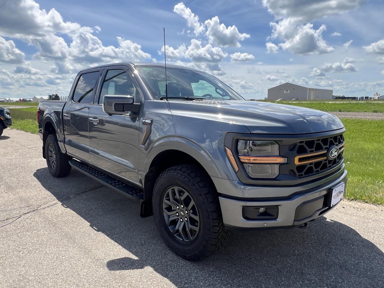The 2026 Ford F-150 Tremor is built for drivers who demand more than just a truck  its a capable, off-road-ready workhorse powered by a 3.5L V6, wrapped in Carbonized Grey Metallic, and loaded with tech and safety features that make every drive smarter and safer. With the Tremor trim, you get serious capability without sacrificing comfort or convenience.

- 3.5L 6-cylinder engine paired with an Automatic transmission and full-time 4WD for confident performance on and off the road
- All-terrain tires (275/70R18) and 18 alloy wheels with a dark matte finish give it aggressive, trail-ready stance
- Tow/Haul Package with Class IV towing equipment including trailer sway control and 3.73 electronic locking axle ratio
- Ford Co-Pilot360 suite including Blind Spot Information System (BLIS), Cross-Traffic Alert with Reverse Brake Assist, and front/rear parking sensors
- Voice-activated dual zone automatic air conditioning and connected navigation system for a refined in-cab experience
- Hill Descent and Hill Hold Control plus 4-wheel disc brakes with ABS for commanding control in tough terrain
- Aerial view camera system and collision mitigation for added confidence when maneuvering in tight spots
- Engine Block Heater included  ready for Canadian winters from day one

Ready to put this Tremor to work? Visit Merit Ford Sales to book a test drive, reserve this vehicle, or contact us with any questions. With only 12 km on the odometer, this one wont last long.