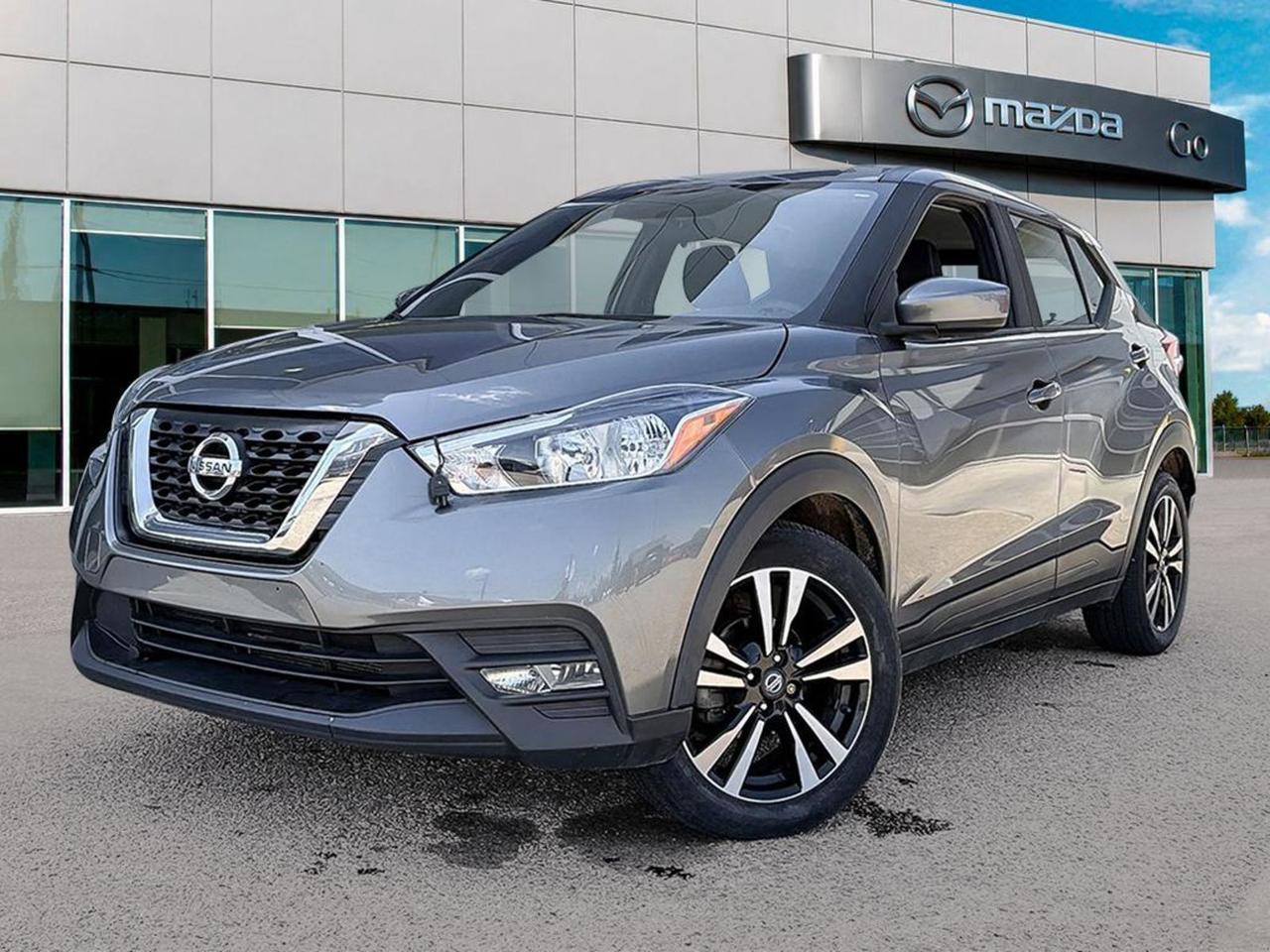 Discover smart efficiency and style with this pre-owned 2019 Nissan Kicks SV in sleek Grey! Perfectly equipped for city living and weekend adventures, this FWD compact SUV blends practicality with advanced features:- Smooth CVT transmission with selectable drive modes for a comfortable, fuel-efficient ride.- 7 airbags and comprehensive safety tech including forward collision mitigation, blind spot and rear collision warnings, plus an aerial view camera system.- Modern connectivity with a 7-inch touchscreen, USB ports, Bluetooth handsfree, voice-activated controls, and keyless push-button start.- Comfort-focused features include heated driver and passenger seats, automatic climate control, and spacious seating for five.- Stylish exterior detailing with heated body-colored mirrors, LED daytime running lights, and 17-inch machined wheels.- Ample cargo space enhanced by a roof rack and rigid cargo cover for all your gear.Reliable, economical, and packed with tech  this Nissan Kicks SV is ready to elevate your daily drive. Schedule your test drive today at Go Mazda and experience versatility that keeps up with your lifestyle!Go Mazda is an AMVIC licensed businessThis vehicle is showing a CarFax incident in the amount of $2,568.80