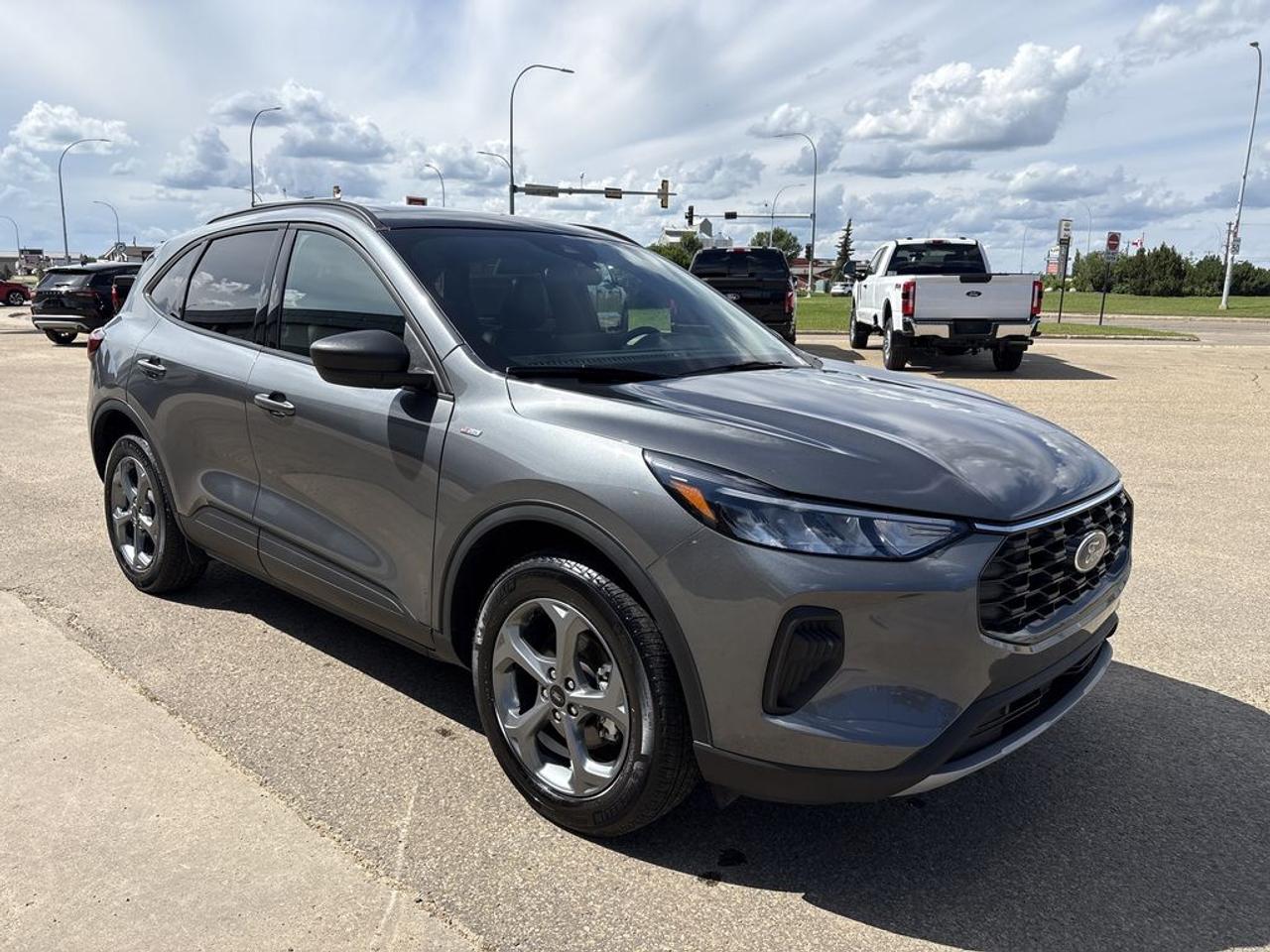THE PRICE YOU SEE, PLUS GST. GUARANTEED!APPLE CARPLAY/ANDROID AUTO COMPATABLE! PREVIOUS FORD EXECUTIVE DRIVEN VEHICLE!    Ford Blue Advantage.  Rates from 5.09% to 5.89% available.  Comes with Blue Plan - additional 6 / 10,000KM PreimiumCare ESP, SiriusXM 3 Month Activation, Connected Services Trial 90 days, 10,000 Ford Rewards Points, Full tank of Fuel.1.5 LITER ECOBOOST, 8 SPEED AUTO, ST-LINE TRIM(300a), EBONY/RED STITCH CLOTH/VINYL SEATS, HEATED FRONT SEATS, COLD WEATHER PKG, HEATED STEERING WHEEL, TECK PKG #1, ADAPTIVE CRUISE, PANORAMIC VISTA ROOF, FORD PASS CONNECT, REMOTE START, SYNC 4.     The 2025 Ford Escape ST-Line AWD with the 300A package offers a stylish and sporty variant of Fords popular compact SUV, combining performance, technology, and convenience features. Equipped with all-wheel drive, it provides enhanced stability and traction across diverse road conditions, making it suitable for various climates and terrains. The 300A package typically includes a suite of advanced technology and comfort features, such as a premium infotainment system, upgraded interior materials, and additional driver-assistance technologies. The Cold Weather Package adds practical features designed for winter driving, including heated seats, a heated steering wheel, and possibly heated mirrors, ensuring comfort and visibility in colder climates. Under the hood, the Escape is powered by a lively 1.5-liter EcoBoost turbocharged three-cylinder engine, known for its balance of performance and fuel efficiency. This engine delivers responsive acceleration and a smooth ride, making it ideal for daily commuting and longer trips. Do you want to know more about this vehicle, CALL, CLICK OR COME ON IN!*AMVIC Licensed Dealer; CarFax and Full Mechanical Inspection Included.