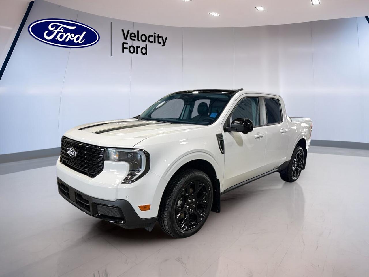 Brand new and ready for work or weekend duty, the 2026 Ford Maverick LARIAT AWD Black appearance Pkg brings smart size, strong utility, and modern comfort to Moose Jaw drivers. Finished in White with four doors, this compact truck pairs all-wheel drive confidence with a 2.0-litre unleaded engine and a smooth continuously variable transmission.

Built for buyers who want truck versatility without the bulk of a full-size pickup, the 2026 Ford Maverick LARIAT AWD Black appearance Pkg stands out with useful daily features and an upscale feel. It also adds a bold Black appearance package look, while keeping the focus on practical value, easy driving, and efficient performance.

FEATURES OF THE Maverick LARIAT AWD Black appearance Pkg
»» Black appearance package adds bold styling
»» All-wheel drive for added traction
»» White exterior with four-door practicality
»» Compact truck size suits city driving

ADVANCED SAFETY FEATURES
»» Backup camera helps with reversing confidence
»» Blind spot monitor supports safer lane changes
»» Lane departure warning adds driving awareness
»» Multiple airbags help protect occupants

PERFORMANCE AND EFFICIENCY
»» 2.0-litre unleaded engine delivers solid power
»» All-wheel drive improves year-round traction
»» Continuously variable transmission supports smooth operation
»» 907-kg towing capacity adds useful capability

COMFORT AND CONVENIENCE
»» Dual-zone climate control keeps comfort balanced
»» Heated front seats help on cold mornings
»» Remote starter adds seasonal daily convenience
»» Power driver seat includes lumbar support

TECHNOLOGY AND CONNECTIVITY
»» Navigation system helps guide every trip
»» Bluetooth integration supports hands-free calling
»» Wi-Fi hotspot keeps devices connected
»» Satellite radio expands in-cabin entertainment

TRUCK FEATURES
»» 907-kg towing capacity supports light hauling
»» Rear tow hook adds practical utility
»» Four-door cabin improves passenger access
»» Compact bed size aids easy manoeuvring

CARGO SPACE
»» Truck bed handles daily gear easily
»» Cabin storage helps organize smaller items
»» Four-door layout adds flexible carrying space
»» Compact dimensions simplify urban loading tasks

WHAT OTHER OWNERS LIKE
»» Easy manoeuvring compared with larger trucks
»» Comfortable ride for daily commuting
»» Useful bed for home improvement tasks
»» Smart technology features feel easy to use

This 2026 Ford Maverick LARIAT AWD Black appearance Pkg gives you the features many drivers want most, including cruise control, power steering, power windows, heated mirrors, electric mirrors, automatic headlights, LED headlamps, tinted windows, steering wheel audio controls, push button start, and automatic door locks. These details help make every drive simpler and more enjoyable.

This new truck also supports confidence with anti-lock braking system, stability control, tire pressure monitoring, child safety locks, passenger airbag sensor, head side airbags, side impact airbags, and a backup camera. Inside, front air conditioning, automatic climate control, illuminated vanity mirrors, HD Radio, and ambient lighting package help create a refined cabin experience.

At Velocity Ford in Moose Jaw, this Maverick is a smart choice for drivers who need everyday flexibility, modern safety, and truck usefulness in one well-equipped package. It is ready to tow, commute, and handle changing Prairie conditions with confidence.

This 2026 Ford Maverick LARIAT AWD Black appearance Pkgs VIN is: 3FTTW8SA6TRA47568.