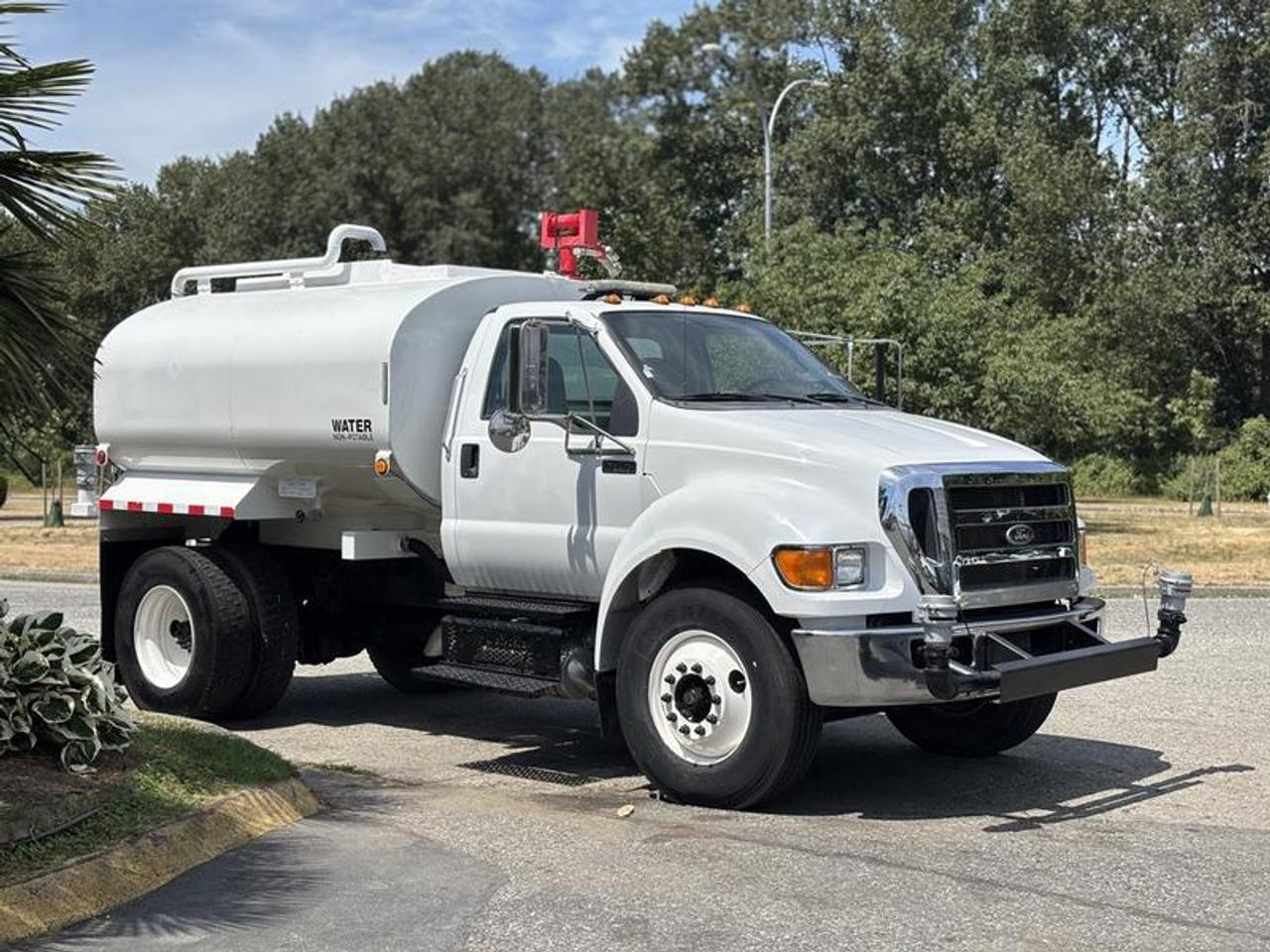 This 2015 Ford F-750 Regular Cab water truck is powered by a 6.7L Power Stroke V8 turbo diesel engine paired with a manual transmission and configured as a 4x2. Built for dust suppression, construction support, road maintenance, landscaping, and municipal fleet applications, this truck provides a practical medium-duty platform for commercial water distribution.

Equipped with a water sprayer system, air brakes, and a roof-mounted lightbar, this truck is well suited for worksite and roadside operations where visibility and controlled water application are required. Additional features include air conditioning and heat, AM/FM radio, and cruise control for operator comfort during daily use.

Finished in white with a gray vinyl interior, this Ford F-750 offers a durable and capable water truck configuration suitable for construction, industrial, and municipal fleet operations. This item is currently OFFSITE. You must register an appointment with our office to schedule an offsite viewing. Appointments must be made a minimum of one business day in advance (and as defined by the days that Repo.com is open for business) before your appointment can be scheduled and confirmed. We may, at our own discretion, instead opt to transport smaller items to Repo.coms main yard for viewing purposes.  $93,830.00 plus $375 processing fee, $94,205.00 total payment obligation before taxes.   Listing report, warranty, contract commitment cancellation fee, financing available on approved credit (some limitations and exceptions may apply). All above specifications and information is considered to be accurate but is not guaranteed and no opinion or advice is given as to whether this item should be purchased. We do not allow test drives due to theft, fraud, acts of vandalism and undetectable impaired driving. Instead we provide the following benefits: Complimentary Warranty (with options to extend), Limited Money Back Satisfaction Guarantee on Fully Completed Contracts, Contract Commitment Cancellation, and an Open-Ended Sell-Back Option. Ask seller for details or call 604-522-REPO(7376) to confirm listing availability.