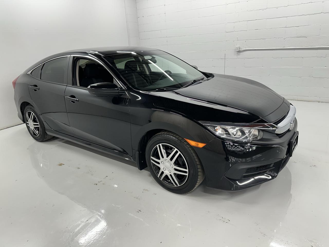 <p>Looking for an engaging and fuel-efficient ride that still offers that pure driving connection? Troys Toys has a fantastic option for you: a sleek, black on black 2018 Honda Civic LX MANUAL. This isnt just any Civic; its a sedan designed for those who appreciate the art of driving. With a reliable 2.0L I4 engine powering its front-wheel drive system, this Civic delivers a responsive and enjoyable experience on every journey, whether its your daily commute or a weekend escape. The classic black exterior and interior combination gives it a timeless and sophisticated look thats sure to turn heads.</p><p>This particular 2018 Honda Civic LX MANUAL at Troys Toys has 94,428 kilometers on the odometer, showcasing its well-traveled yet ready-for-more spirit. The four-door sedan body style offers practicality and comfort for passengers, while the manual transmission puts you firmly in control, allowing for a more dynamic and connected feel to the road. It&rsquo;s a perfect blend of sensible design and driving enthusiasm, making it a standout choice for discerning drivers.</p><p>Here are 5 sizzling features of this 2018 Honda Civic LX MANUAL:</p><ul><li><strong>The Thrill of a Manual Transmission:</strong> Experience the ultimate control and engagement with a true stick shift, making every drive a more involved and exhilarating experience.</li><li><strong>Iconic Honda Reliability:</strong> Own a piece of automotive legend with Hondas renowned reputation for building durable and dependable vehicles that stand the test of time.</li><li><strong>Fuel-Efficient 2.0L I4 Engine:</strong> Enjoy impressive mileage and responsive performance, keeping your wallet happy and your adventures going longer.</li><li><strong>Sharp Black on Black Aesthetics:</strong> Turn heads with a sophisticated and timeless colour combination that exudes understated cool and timeless style.</li><li><strong>Practical 4-Door Sedan Versatility:</strong> Effortlessly combine sporty driving with everyday practicality, offering ample space for passengers and cargo in a sleek sedan package.</li></ul><p><strong><em>Powered by AutoIntelligence&trade;</em></strong></p><p>Vehicle information has been generated using artificial intelligence and is provided for informational purposes only. While efforts are made to ensure accuracy, please confirm all details directly with the dealer.</p>