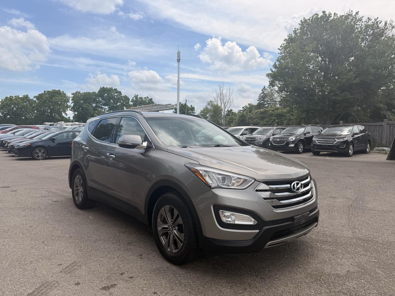 <p>Looking for a reliable and versatile SUV to handle your daily commute and weekend adventures? Target Auto Centre has a fantastic option for you: a 2014 Hyundai Santa Fe Sport Premium in a sophisticated brown exterior with a sleek black interior. This well-maintained Santa Fe boasts a practical 2.4L V4 engine paired with a smooth automatic transmission, offering an efficient yet capable driving experience for all your journeys. Its spacious SUV/Crossover body style provides ample room for passengers and cargo, making it an ideal choice for families, active individuals, or anyone who appreciates versatility. With only 98,099 km on the odometer, this Santa Fe Sport is ready to serve you for many more kilometers to come.&nbsp;This 2014 Hyundai Santa Fe Sport Premium is packed with features designed to enhance your driving pleasure and convenience. Imagine effortlessly navigating various weather conditions with confidence, thanks to the included two sets of tires &ndash; one for summer performance and another for winter traction, ensuring youre prepared year-round. Sink into the comfortable and stylish black interior, designed for both durability and a premium feel. The automatic transmission ensures a smooth and effortless driving experience, taking the stress out of stop-and-go traffic or long highway stretches. As a Premium trim, you can expect a suite of thoughtful amenities that elevate your everyday driving. Plus, with its robust SUV/Crossover body style, youll enjoy a commanding view of the road and the flexibility to carry all your gear with ease.</p><p>&nbsp;</p><hr><p>&nbsp;</p><p dir=ltr><strong>CERTIFIED PRE-OWNED VEHICLE | BUY WITH CONFIDENCE</strong></p><p dir=ltr>&nbsp;- Ontario Safety Standards Certificate Included<br>- 30 Day / 1,000 KM Safety Warranty Included<br>- Fully Detailed Prior to Delivery<br>- CARFAX Vehicle History Report Available<br>&nbsp; (View on Our Website)</p><p>&nbsp;</p><hr><p>&nbsp;</p><p dir=ltr><strong>VALUE AND TRANSPARENCY | WHY CHOOSE US</strong></p><p dir=ltr>- Price Plus HST & Licensing Only<br>- No Additional Fees | All-In Pricing<br>- Same Price Cash or Finance<br>- Extended Warranty Protection Plans Available<br>- Autotrader Best Priced Dealer Award (2024)<br>- Competitive Market Value on Trade-ins<br>- We&rsquo;ll Buy Your Car &mdash; No Purchase Required<br>- Know Someone Looking For a Vehicle? Get a Referral Award<br>- Open 7 Days a Week</p><p>&nbsp;</p><hr><p>&nbsp;</p><p dir=ltr><strong>ABOUT TARGET AUTO CENTRE</strong></p><p dir=ltr>Target Auto Centre has been proudly serving London, Ontario and surrounding areas for over 20 years, offering over 150 quality pre-owned vehicles and a constantly updated selection to choose from. We focus on providing competitive pricing, clear information, and a straightforward buying process so you know exactly what to expect from start to finish.</p><p dir=ltr>Cars For Everyone! We offer a wide selection of vehicles to fit every lifestyle, need, and budget. Our inventory includes cars, trucks, SUVs, and vans from trusted brands such as Ford, Chevrolet, Toyota, Honda, Nissan, BMW, Mercedes-Benz, Audi, Lexus, Acura, Hyundai, Kia, Mazda, Volkswagen, Jeep, RAM, GMC, Subaru, and more. With new arrivals regularly, there&rsquo;s always something for everyone.</p><p dir=ltr>As a proud member of the Used Car Dealers Association of Ontario (UCDA), we are committed to operating with honesty, transparency, and professionalism in every transaction. Our goal is to make your vehicle purchase as simple and stress-free as possible, while delivering the level of service our customers continue to trust. Come visit us today and see why were the preferred choice for pre-owned vehicles in London and the surrounding areas. We look forward to earning your business!</p><p>&nbsp;</p>