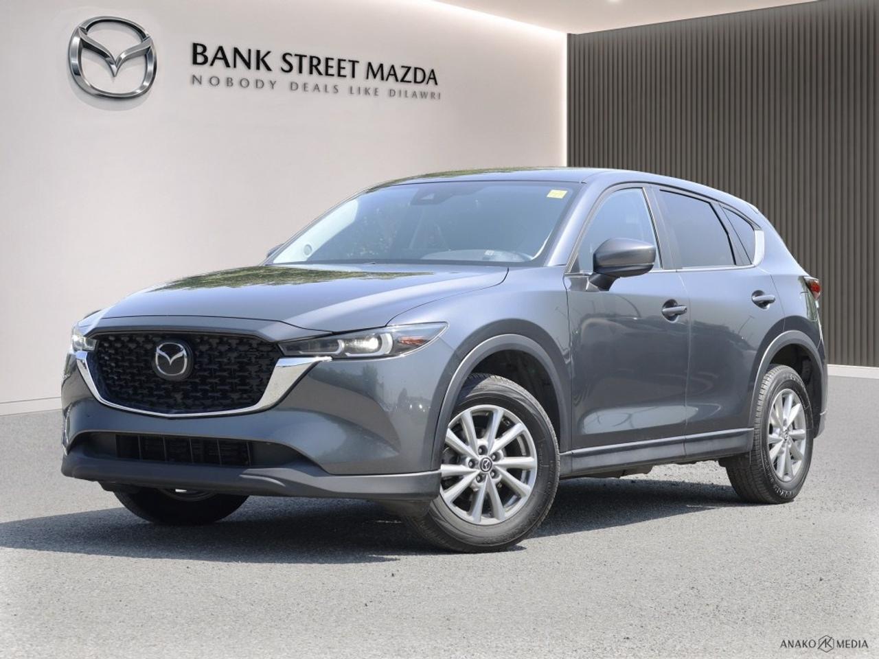 Introducing the 2024 Mazda CX-5 GS AWD, elegantly presented in a sophisticated gray. With its all-wheel-drive system and a balanced automatic transmission, this SUV promises a confident and dynamic driving experience that handles with ease. The exterior of this Mazda CX-5 captures attention with its stylish design and robust alloy wheels, providing a statement of understated luxury. Upon entering, you are greeted by a refined interior featuring leatherette door trim inserts and a leather gear shifter, paired with heated front seats and a leather steering wheel for your comfort. Equipped with the latest in automotive technology, the CX-5 includes a user-friendly smart device integration, allowing seamless connectivity on the go. Safety is top-notch with advanced features like lane assist, adaptive cruise control, and a reliable backup camera, all designed to give you peace of mind on every journey. This vehicle is ideal for those who seek a blend of sophistication and functionality without compromise. Perfect for families or individuals looking for safety, luxury, and advanced technology in their vehicle. Contact Bank Street Mazda today to find out more about how this 2024 Mazda CX-5 can fit your lifestyle.