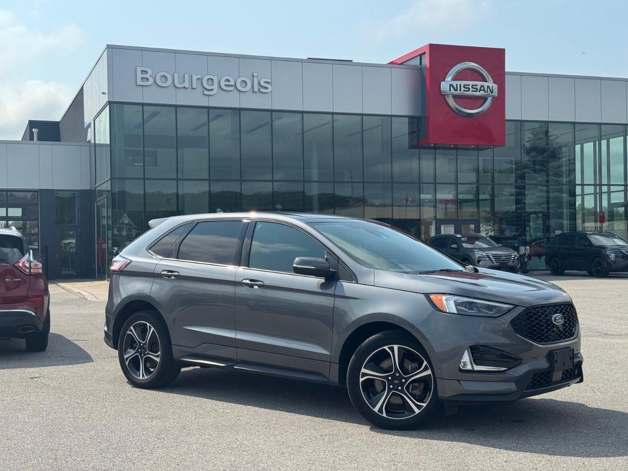 <p>Get behind the wheel of the 2022 Ford Edge ST, everything you've ever wanted in an SUV and more. Painted in a sophisticated gray hue and equipped with an AWD drivetrain, this ST AWD model offers exceptional handling and deliverance on the road. Its sport-tuned suspension and dynamic performance make every drive exciting.</p> <p>Designed with allure and luxury in mind, the Ford Edge ST stands out with its stylish alloy wheels and imposing presence. The spacious black interior is adorned with comfortable leather seats, offering heated front seating for those crisp Canadian mornings. The leather steering wheel, paired with leatherette door trim inserts, accentuates the refined nature of the cabin.</p> <p>Stay connected and entertained with smart device integration and a wi-fi hotspot. The backup camera and parking sensors make maneuvering in tight spots a breeze, while advanced safety features like lane assist and brake assist provide additional peace of mind. Relax knowing your vehicle is fitted with the latest driver assistance technology, including keyless entry and remote start for ultimate convenience.</p> <p>This vehicle is perfect for those seeking a blend of performance, comfort, and cutting-edge technology in their daily drive. Whether you're navigating city streets or exploring the open road, the 2022 Ford Edge ST is prepared for the journey. Reach out to Bourgeois Midland Nissan today to learn more or schedule a test drive.</p> <p><strong>Why Choose the Bourgeois Auto Group?</strong></p><p>For 80 years, Bourgeois Auto Group has been delivering exceptional automotive experiences. Our factor trained teams work to ensure you receive the shopping experience you deserve; whether you're looking for a new or new-to-you vehicle.</p><p>Shop 24/7 with our online showroom and chat service, ensuring convenience every step of the way. No hidden fees, full disclosure, and every pre-owned vehicle comes with a Carfax® report for peace of mind.</p><p>We offer a wide selection of pre-owned vehicles, all competitively priced using real-time market data. Get the best deal on your purchase and trade-in with our free Live Market Analysis report.</p><p>Looking to sell your car? We buy any make or modelno purchase required. Our simple to use online trade valuation tool will provide you with a clear, transparent selling experience whether you buy our car or not.</p><p>Backed by hundreds dedicated employees across 4 convenient locations, were here to meet all your automotive needs. Visit us in Midland or Parry Sound and explore our inventory or schedule your next service today.</p> <p><strong>Financing Your Next Vehicle with Bourgeois Midland Nissan:</strong></p><p>At Bourgeois Midland Nissan, we make financing your next vehicle simple and stress-free! Our team works with trusted lenders to find flexible options tailored to your budget. Drive away with confidenceapply today!</p><p>Take advantage of our online pre-qualification tool, backed by Equifax and TD Bank to find the payment that works for you. Simply <a href=https://www.bourgeoisnissan.com/pre-qualify-for-financing/ rel=nofollow><strong>CLICK HERE</strong></a> to use our secure online credit tool with no impact to your credit.</p>