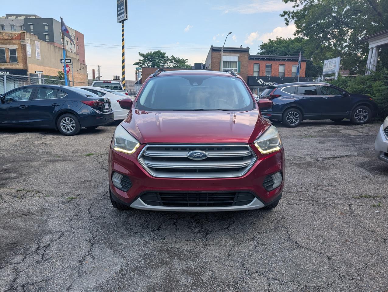<p class=font-claude-response-body break-words whitespace-normal><strong>2018 Ford Escape SE AWD &mdash; ONLY 49,380 KM &mdash; Certified</strong></p><p class=font-claude-response-body break-words whitespace-normal>Rare low-kilometre 2018 Ford Escape SE AWD with just <strong>49,380 km</strong> &mdash; thats roughly half the average for the year. Comes <strong>safetied and certified</strong>, ready to drive home.</p><p class=font-claude-response-body break-words whitespace-normal><strong>Features:</strong></p><ul class=[li_&]:mb-0 [li_&]:mt-1 [li_&]:gap-1 [&:not(:last-child)_ul]:pb-1 [&:not(:last-child)_ol]:pb-1 list-disc flex flex-col gap-1 pl-8 mb-3><li class=font-claude-response-body whitespace-normal break-words pl-2>1.5L EcoBoost, All-Wheel Drive</li><li class=font-claude-response-body whitespace-normal break-words pl-2>Leather seats</li><li class=font-claude-response-body whitespace-normal break-words pl-2>Alloy wheels</li><li class=font-claude-response-body whitespace-normal break-words pl-2>Backup camera, heated seats, dual-zone climate, Bluetooth</li><li class=font-claude-response-body whitespace-normal break-words pl-2>Clean, well-kept interior</li></ul><p class=font-claude-response-body break-words whitespace-normal><strong>Full disclosure &mdash; we believe in transparency:</strong></p><ul class=[li_&]:mb-0 [li_&]:mt-1 [li_&]:gap-1 [&:not(:last-child)_ul]:pb-1 [&:not(:last-child)_ol]:pb-1 list-disc flex flex-col gap-1 pl-8 mb-3><li class=font-claude-response-body whitespace-normal break-words pl-2><strong>The A/C is not currently working and needs</strong> service. Price reflects this.</li><li class=font-claude-response-body whitespace-normal break-words pl-2>Carfax shows a repaired collision claim. Report available on request &mdash; were happy to go through it with you.</li><li class=font-claude-response-body whitespace-normal break-words pl-2>Sold <strong>certified</strong>, no extended warranty included.</li></ul><p class=font-claude-response-body break-words whitespace-normal>At this kilometre reading, Escapes like this dont come around often. Priced accordingly at <strong>$14,999 + HST & licensing.</strong></p><p class=font-claude-response-body break-words whitespace-normal>Financing available OAC. Trades welcome.</p><p class=font-claude-response-body break-words whitespace-normal>📍 M.A. Used Auto Sales &mdash; 758 King St. East, Hamilton, ON<br>📞 Call or text to book your test drive.<br>Carfax attached.</p>