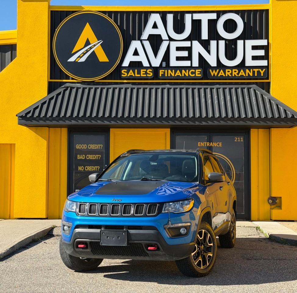 This outstanding example of a 2021 Jeep Compass Trailhawk is proudly offered by Auto Avenue Airdrie. <br/> Combining legendary Jeep capability with modern comfort and versatility, this 2021 Jeep Compass Trailhawk is built to take on both city streets and off-road adventures with confidence. Its bold styling, refined interior, and impressive performance make it an excellent choice for drivers who demand capability without sacrificing everyday comfort. <br/> Equipped with Jeeps renowned Four Wheel Drive system, this Compass delivers outstanding traction, stability, and confidence in a variety of road and weather conditions. Inside, youll find a premium leather-appointed interior featuring heated front seats, a power-adjustable drivers seat, a large touchscreen display, and a panoramic sunroof, creating a comfortable and connected driving experience. A backup camera further enhances convenience and confidence while maneuvering. <br/> Designed with rugged capability, advanced technology, and everyday practicality in mind, the Jeep Compass Trailhawk continues to set itself apart in the compact SUV segment. Whether youre commuting, exploring the outdoors, or heading out on your next road trip, this SUV is ready for the journey. <br/> Capable, comfortable, and loaded with premium features, this 2021 Jeep Compass Trailhawk is ready for its next adventure. <br/> AUTO AVENUE IS AN AMVIC LICENSED DEALERSHIP, COMMITTED TO PROVIDING EXCEPTIONAL SERVICE AND QUALITY VEHICLES WITH FLEXIBLE PAYMENT OPTIONS. <br/>