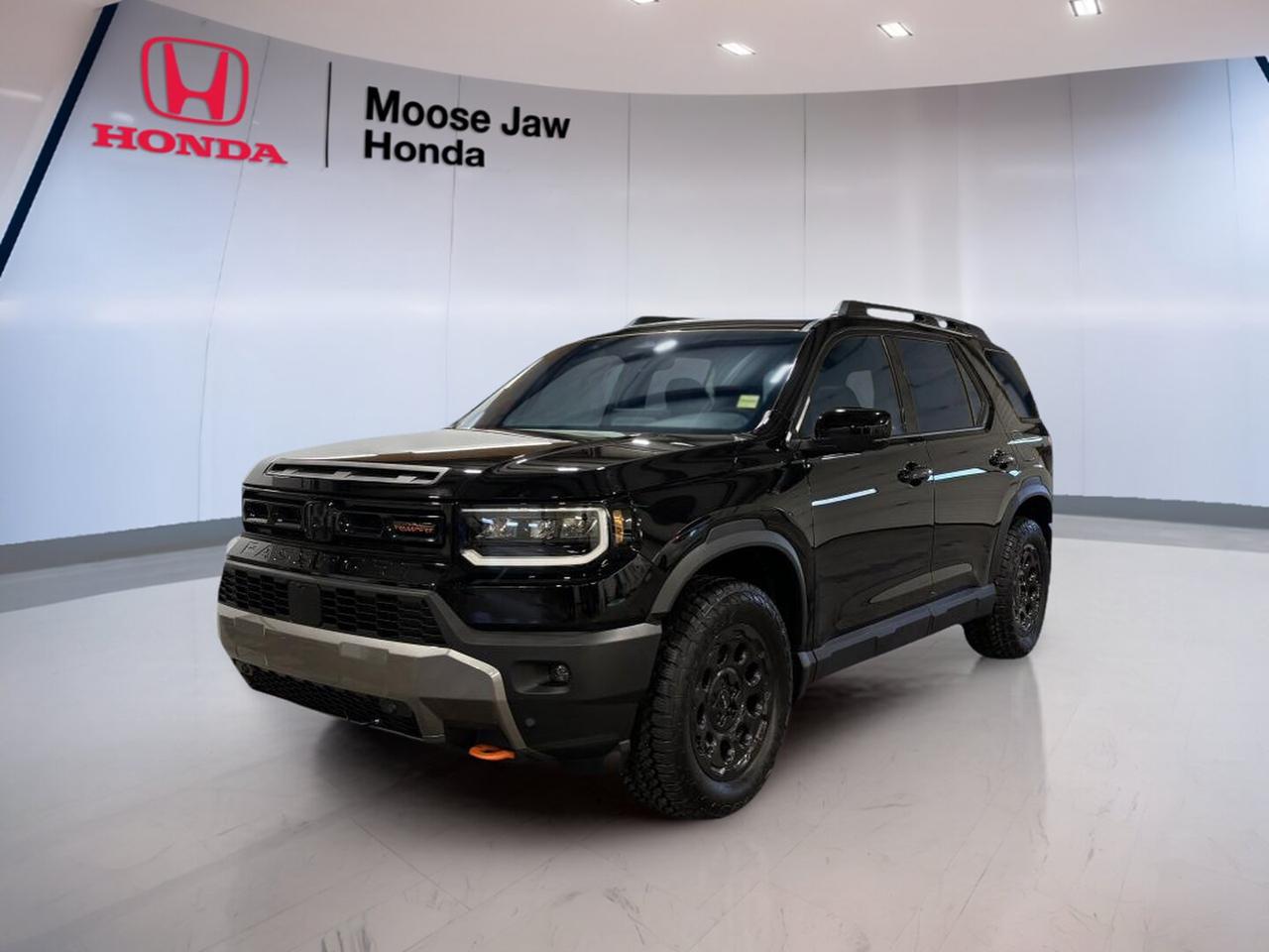 Discover the confidence and capability of the brand new 2026 Honda Passport TrailSport Touring at Moose Jaw Honda in Moose Jaw. Finished in Black with a Black interior, this midsize SUV blends rugged design, proven V6 power, and everyday comfort for drivers who want space, strength, and year-round readiness.

Built for Canadian roads and changing conditions, the 2026 Honda Passport TrailSport Touring features a 3.5-litre 24-valve DOHC V6 engine with dual variable timing control, a 10-speed automatic transmission with shift capability, and all-wheel drive. It delivers smooth highway power, easy passing response, and composed traction in rain, snow, and gravel.

FEATURES OF THE Passport Trailsport Touring

»» TrailSport styling adds rugged visual appeal
»» V6 power supports strong daily driving
»» All-wheel drive boosts all-season confidence
»» Touring trim adds premium convenience touches

ADVANCED SAFETY FEATURES

»» Advanced airbag system helps protect occupants
»» Stability control supports confident road handling
»» Traction control improves grip on surfaces
»» Anti-lock brakes aid controlled stopping

PERFORMANCE AND EFFICIENCY

»» 3.5-litre V6 delivers smooth strong power
»» 10-speed automatic supports refined cruising
»» All-wheel drive enhances year-round capability
»» Dual variable timing improves engine response

COMFORT AND CONVENIENCE

»» Spacious cabin supports family travel comfort
»» Four-door SUV design allows easy access
»» Automatic transmission helps reduce driving effort
»» Black interior creates a clean look

TECHNOLOGY AND CONNECTIVITY

»» Clear driver information supports daily awareness
»» Shift function adds extra driving control
»» Modern controls are easy to reach
»» Smart cabin layout feels user-friendly

CARGO SPACE

»» Large rear cargo area fits gear
»» Wide opening helps loading bulky items
»» Flexible SUV layout supports daily errands
»» Useful storage space suits road trips

WHAT OTHER OWNERS LIKE

»» Strong V6 power for easy passing
»» Confident all-wheel drive in winter
»» Spacious cabin for passengers and cargo
»» Comfortable ride for long highway trips

The 2026 Honda Passport TrailSport Touring is a smart choice for drivers who need real utility without giving up refinement. Its bold Black exterior gives it a clean, athletic look, while the capable all-wheel-drive system helps keep you moving with confidence through Saskatchewan weather and beyond.

This brand new 2026 Honda Passport TrailSport Touring is well suited for busy family life, weekend escapes, and daily commuting alike. With its strong V6 engine, smooth 10-speed automatic transmission, and practical SUV versatility, it offers the balance of power, comfort, and capability many Canadian drivers want in one dependable package.

This 2026 Honda Passport Trailsport Tourings VIN is: 5FNYF9H8XTB507445.<p>Discover the confidence and capability of the brand new 2026 Honda Passport TrailSport Touring at Moose Jaw Honda in Moose Jaw. Finished in Black with a Black interior</p>
<p> the 2026 Honda Passport TrailSport Touring features a 3.5-litre 24-valve DOHC V6 engine with dual variable timing control</p>
<p> and gravel.

FEATURES OF THE Passport Trailsport Touring

»» TrailSport styling adds rugged visual appeal
»» V6 power supports strong daily driving
»» All-wheel drive boosts all-season confidence
»» Touring trim adds premium convenience touches

ADVANCED SAFETY FEATURES

»» Advanced airbag system helps protect occupants
»» Stability control supports confident road handling
»» Traction control improves grip on surfaces
»» Anti-lock brakes aid controlled stopping

PERFORMANCE AND EFFICIENCY

»» 3.5-litre V6 delivers smooth strong power
»» 10-speed automatic supports refined cruising
»» All-wheel drive enhances year-round capability
»» Dual variable timing improves engine response

COMFORT AND CONVENIENCE

»» Spacious cabin supports family travel comfort
»» Four-door SUV design allows easy access
»» Automatic transmission helps reduce driving effort
»» Black interior creates a clean look

TECHNOLOGY AND CONNECTIVITY

»» Clear driver information supports daily awareness
»» Shift function adds extra driving control
»» Modern controls are easy to reach
»» Smart cabin layout feels user-friendly

CARGO SPACE

»» Large rear cargo area fits gear
»» Wide opening helps loading bulky items
»» Flexible SUV layout supports daily errands
»» Useful storage space suits road trips

WHAT OTHER OWNERS LIKE

»» Strong V6 power for easy passing
»» Confident all-wheel drive in winter
»» Spacious cabin for passengers and cargo
»» Comfortable ride for long highway trips

The 2026 Honda Passport TrailSport Touring is a smart choice for drivers who need real utility without giving up refinement. Its bold Black exterior gives it a clean</p>
<p> while the capable all-wheel-drive system helps keep you moving with confidence through Saskatchewan weather and beyond.

This brand new 2026 Honda Passport TrailSport Touring is well suited for busy family life</p>
<p> and capability many Canadian drivers want in one dependable package.

This 2026 Honda Passport Trailsport Tourings VIN is: 5FNYF9H8XTB507445.</p>