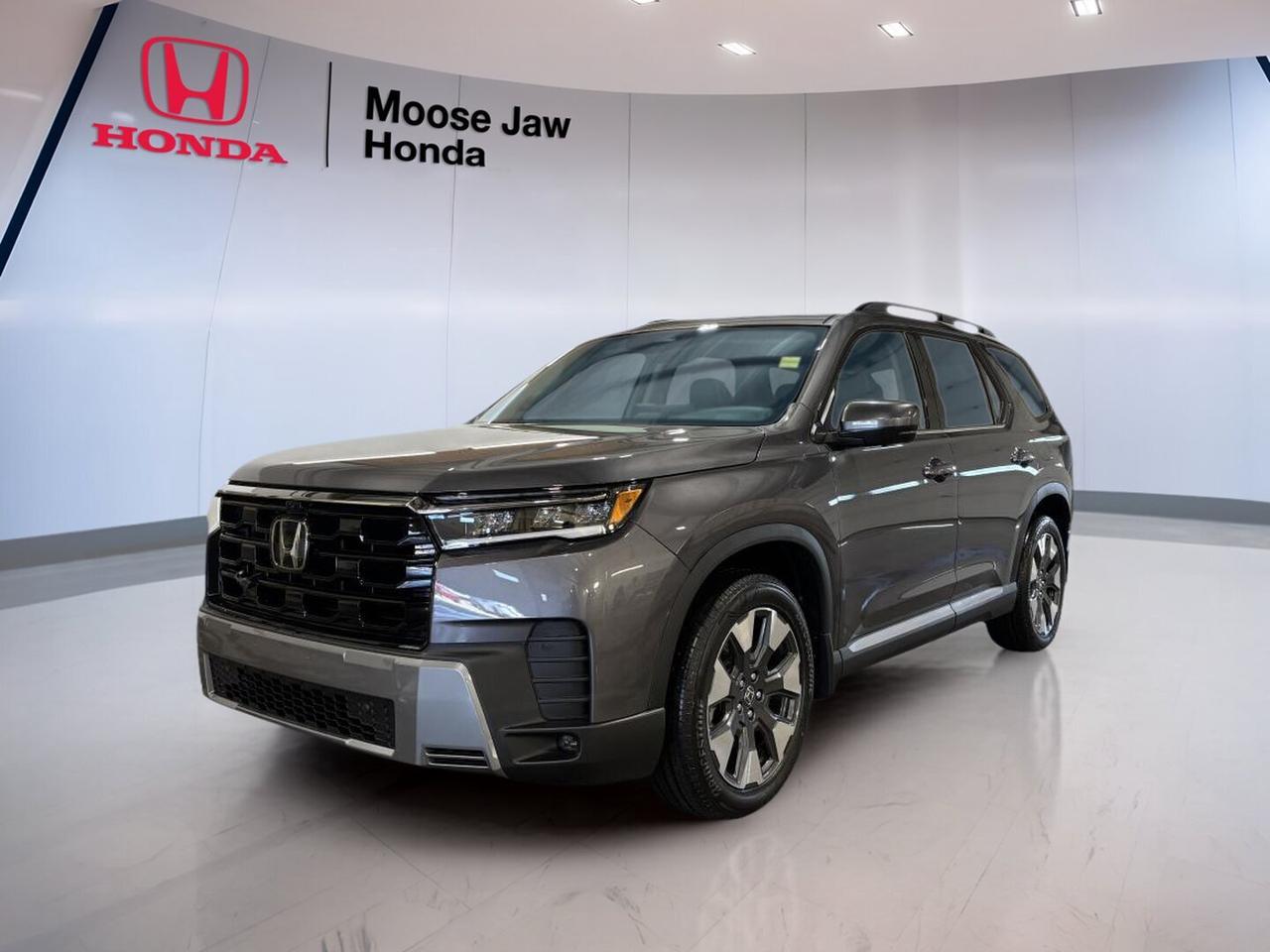 Meet the brand new 2026 Honda Pilot Touring at Moose Jaw Honda in Moose Jaw. Finished in Grey with a Black interior, this three-row SUV blends family-ready space, confident V6 power, and refined road manners. The 2026 Honda Pilot Touring is built for busy weekdays, long highway trips, and all-season driving in Saskatchewan.

With its 3.5-litre V6 engine, 10-speed automatic transmission, and all-wheel drive, the 2026 Honda Pilot Touring delivers smooth response and steady traction. Its bold utility, roomy cabin, and practical layout make it a smart choice for drivers who want comfort, versatility, and everyday confidence in one capable SUV.

FEATURES OF THE Pilot Touring
»» Grey exterior with Black interior
»» 3.5-litre V6 power and refinement
»» 10-speed automatic transmission included
»» All-wheel drive for added confidence

ADVANCED SAFETY FEATURES
»» Honda Sensing suite supports safer driving
»» Advanced airbag system helps protect occupants
»» Vehicle Stability Assist aids control
»» Traction control supports slippery-road confidence

PERFORMANCE AND EFFICIENCY
»» 3.5-litre V6 delivers smooth acceleration
»» 10-speed automatic supports refined shifting
»» All-wheel drive boosts year-round traction
»» Dual VTC helps optimize engine response

COMFORT AND CONVENIENCE
»» Three-row cabin supports family flexibility
»» Spacious interior suits daily commuting
»» Easy entry helps passenger access
»» Quiet ride adds comfort on trips

TECHNOLOGY AND CONNECTIVITY
»» Driver-focused controls feel clear and simple
»» Modern interface supports daily usability
»» Helpful vehicle information stays accessible
»» Connectivity features support life on-the-go

CARGO SPACE
»» Large rear cargo area adds utility
»» Flexible layout supports changing needs
»» Three-row design handles people and gear
»» Ideal for errands and road trips

WHAT OTHER OWNERS LIKE
»» Smooth V6 power for highway travel
»» Comfortable ride for family driving
»» Useful cabin space and flexibility
»» Confident all-wheel drive capability

The 2026 Honda Pilot Touring is designed for drivers who need real versatility without giving up comfort. Its roomy SUV design makes space for passengers, groceries, sports gear, and weekend luggage. The Grey exterior gives it a clean, upscale look, while the Black interior keeps the cabin practical and easy to live with.

Power comes from a proven 3.5-litre V6 24-valve DOHC engine with Dual VTC, paired with a 10-speed automatic transmission with Shift. This setup helps the 2026 Honda Pilot Touring feel smooth in city traffic and composed at highway speed. All-wheel drive adds extra assurance when roads turn wet, snowy, or uneven.

Inside, this new SUV is made to support active family life. The three-row layout offers the flexibility many Canadian drivers need, whether it is for carpools, vacations, or everyday errands. The cabin is arranged for easy use, with a focus on comfort, visibility, and practical access for both driver and passengers.

At Moose Jaw Honda, this brand new 2026 Honda Pilot Touring stands out as a well-rounded SUV with strong capability and everyday usefulness. If you want V6 performance, all-wheel drive confidence, and the space to handle changing needs, this new Pilot is ready to deliver.

This 2026 Honda Pilot Tourings VIN is: 5FNYG1H75TB504104.