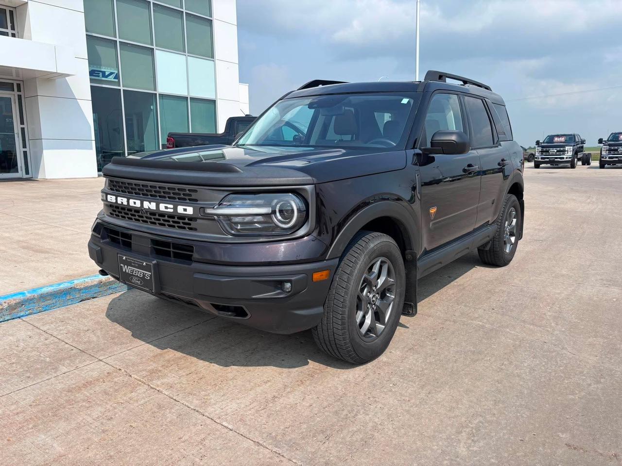 <p>Embark on your next adventure with the rugged and capable 2021 Ford Bronco Sport Badlands 4x4, now available at Webbs 1441. This isnt just an SUV; its your ticket to exploring the unbeaten path with confidence and style. Designed for those who crave excitement, the Bronco Sport Badlands combines iconic Ford toughness with modern comfort and technology, making it the perfect companion for both daily commutes and weekend getaways. With 137,600 kilometers on the odometer, this vehicle has been well-traveled and is ready for many more miles of exploration.</p><p>&nbsp;</p><p>The 2021 Ford Bronco Sport Badlands 4x4 is engineered to tackle diverse terrains. Its robust 4-wheel drive system, coupled with the powerful 2.0L EcoBoost engine, delivers exhilarating performance and the capability to conquer challenging conditions. Whether youre navigating city streets or venturing off-road, the Bronco Sport Badlands offers a commanding presence and a driving experience thats both thrilling and secure.</p><p>&nbsp;</p><p>Here are 5 features that make this Bronco Sport Badlands truly stand out:</p><p><br><br></p><ul><li><strong>Badlands 4x4 Capability:</strong> This trim is specifically designed for off-road prowess, featuring advanced 4x4 systems and terrain management to conquer any trail.</li></ul><p>&nbsp;</p><ul><li><strong>2.0L EcoBoost Engine:</strong> Experience a potent blend of power and efficiency, providing responsive acceleration and the muscle you need for any driving situation.</li></ul><p>&nbsp;</p><ul><li><strong>8-Speed SelectShift Automatic Transmission:</strong> Enjoy smooth, precise gear changes and the flexibility to manually control your shifts for a more engaging driving experience.</li></ul><p>&nbsp;</p><ul><li><strong>Iconic Bronco Sport Design:</strong> Turn heads with the unmistakable, rugged styling that pays homage to the Bronco legacy, blending classic appeal with modern SUV functionality.</li></ul><p>&nbsp;</p><ul><li><strong>4-Door Versatility:</strong> With ample space for passengers and cargo, this 4-door SUV offers practicality without compromising on its adventurous spirit.</li></ul><p><br><br></p><p><strong><em>Powered by AutoIntelligence&trade;</em></strong></p><p>&nbsp;</p><p>Powered by AutoIntelligence&trade;</p><p>&nbsp;</p>
