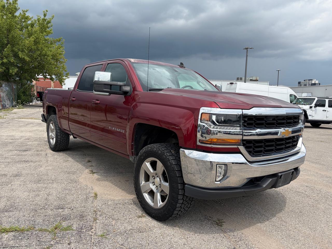 CARFAX lists odometer 24,915km below market average | Trailering Package |<br>LT Preferred Equipment Group | Power Front Seats | Wireless Charger<br><br>6-Speed Automatic Electronic with Overdrive, 4WD, Cloth, 10-Way Power Drivers Seat Adjuster, 110-Volt AC Power Outlet, 150 Amp Alternator, 4 Movable Upper Cargo Tie Downs, 4-Wheel Disc Brakes, 4.2 Diagonal Colour Display Driver Info Centre, 40/20/40 Front Split Bench Seat, 6 Speaker Audio System, ABS brakes, Air Conditioning, AM/FM radio: SiriusXM, Bluetooth® For Phone, Body Colour Bodyside Mouldings, Body Colour Door Handles, Body-Colour Mirror Caps, Body-Colour Pwr Adjustable Heated Outside Mirrors, Brake assist, CD player, Cloth Seat Trim, Colour-Keyed Carpeting w/Rubberized Vinyl Floor Mats, Compass, Deep-Tinted Glass, Delay-off headlights, Driver & Front Passenger Illuminated Vanity Mirrors, Driver door bin, Driver vanity mirror, Dual front impact airbags, Dual front side impact airbags, Dual-Zone Automatic Climate Control, Electric Rear-Window Defogger, Electronic Stability Control, Emergency communication system: OnStar Guidance, Exterior Parking Camera Rear, EZ Lift & Lower Tailgate, Floor Mounted Console, Front & Rear All-Weather Floor Mats, Front anti-roll bar, Front License Plate Kit BC/MB/NB/ON/NL, Front Power Reclining Bucket Seats, Front reading lights, Front wheel independent suspension, Fully automatic headlights, HD Radio, Heated door mirrors, Heated Driver & Front Passenger Seats, Heavy-Duty Rear Locking Differential, High-Intensity Discharge Headlights, Illuminated entry, Integrated Trailer Brake Controller, Interior Driver Assist Handle (LPO), Leather Wrapped Steering Wheel w/Cruise Controls, LED Cargo Box Lighting, Low tire pressure warning, Manual Tilt Wheel Steering Column, Manual Tilt/Telescoping Steering Column, Moulded Black Splash Guards (LPO), Occupant sensing airbag, Outside temperature display, Overhead airbag, Overhead console, Panic alarm, Passenger door bin, Passenger vanity mirror, Power door mirrors, Power steering, Power Windows w/Driver Express Up, Premium audio system: Chevrolet MyLink, Radio data system, Radio: AM/FM 8 Diagonal Colour Touch Screen, Rear 60/40 Folding Bench Seat (Folds Up), Rear reading lights, Rear step bumper, Rear Vision Camera, Rear Wheelhouse Liners, Remote Keyless Entry, Remote Locking Tailgate, Remote Vehicle Starter System, Single Slot CD/MP3 Player, SiriusXM Satellite Radio, Speed control, Speed-sensing steering, Split folding rear seat, Spray-On Pickup Box Bed Liner, Steering Wheel Audio Controls, Steering wheel mounted audio controls, Tachometer, Theft Deterrent System (Unauthorized Entry), Thin Profile LED Fog Lamps, Tilt steering wheel, Traction control, Trailering Package, Trip computer, True North Edition, Variably intermittent wipers, Voltmeter, Wheels: 20 x 9 Polished-Aluminum, Wireless Charging.<br><br>Red Tintcoat<br>2017 Chevrolet Silverado 1500 LT LT1<br>LT1 4D Crew Cab<br>EcoTec3 5.3L V8 6-Speed Automatic Electronic with Overdrive<br>4WD<br><br>Awards:<br>  * 2017 KBB.com 10 Most Awarded Brands<br><br>Reviews:<br>  * Quick acceleration and strong towing/hauling ability thanks to available V8 engines; front seats are comfortable for long drives; cabin is pleasingly quiet at highway speeds; long list of available options allow for extensive customization. Source: Edmunds