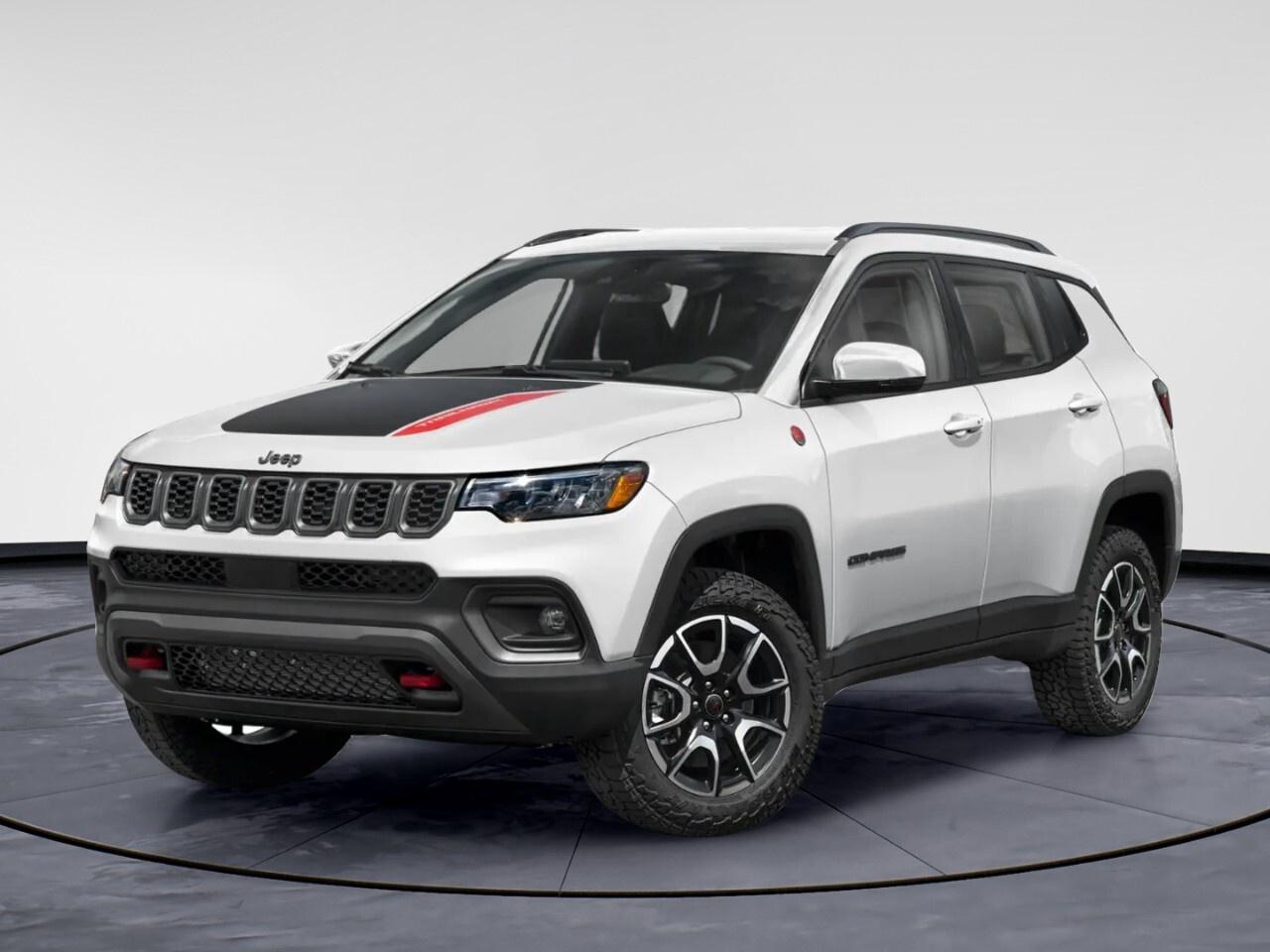 The 2026 Jeep Compass Trailhawk 4x4 comes in an eye-catching bright white finish, perfectly complemented by its rugged 4x4 drivetrain that offers impressive handling on diverse terrains. This SUV is designed for adventure, and its robust build promises durability wherever your journey takes you.

Step inside to a striking interior accented in black with ruby red highlights, featuring premium cloth and leather-faced bucket seats that perfectly blend style with comfort. The alloy wheels add a touch of flair to its strong exterior look, while the standard trailer tow group with a 4-pin wiring harness and Class III hitch receiver makes it ready for any towing needs.

Loaded with technology, this Jeep Compass features an 8-speed automatic transmission paired with a powerful 2.0L DOHC I-4 DI Turbo engine, ensuring a smooth and efficient ride. Stay connected and entertained with smart device integration, Bluetooth connection, and a satellite radio. Safety and convenience are a top priority with advanced features such as lane assist, brake assist, adaptive cruise control, and a backup camera, ensuring peace of mind on the road.

Perfectly suited for those who crave off-road adventures without sacrificing style and technology, this vehicle appeals to both thrill-seekers and everyday drivers. Reach out to Windsor Chrysler today to learn more about how the Jeep Compass Trailhawk 4x4 can meet your driving needs.