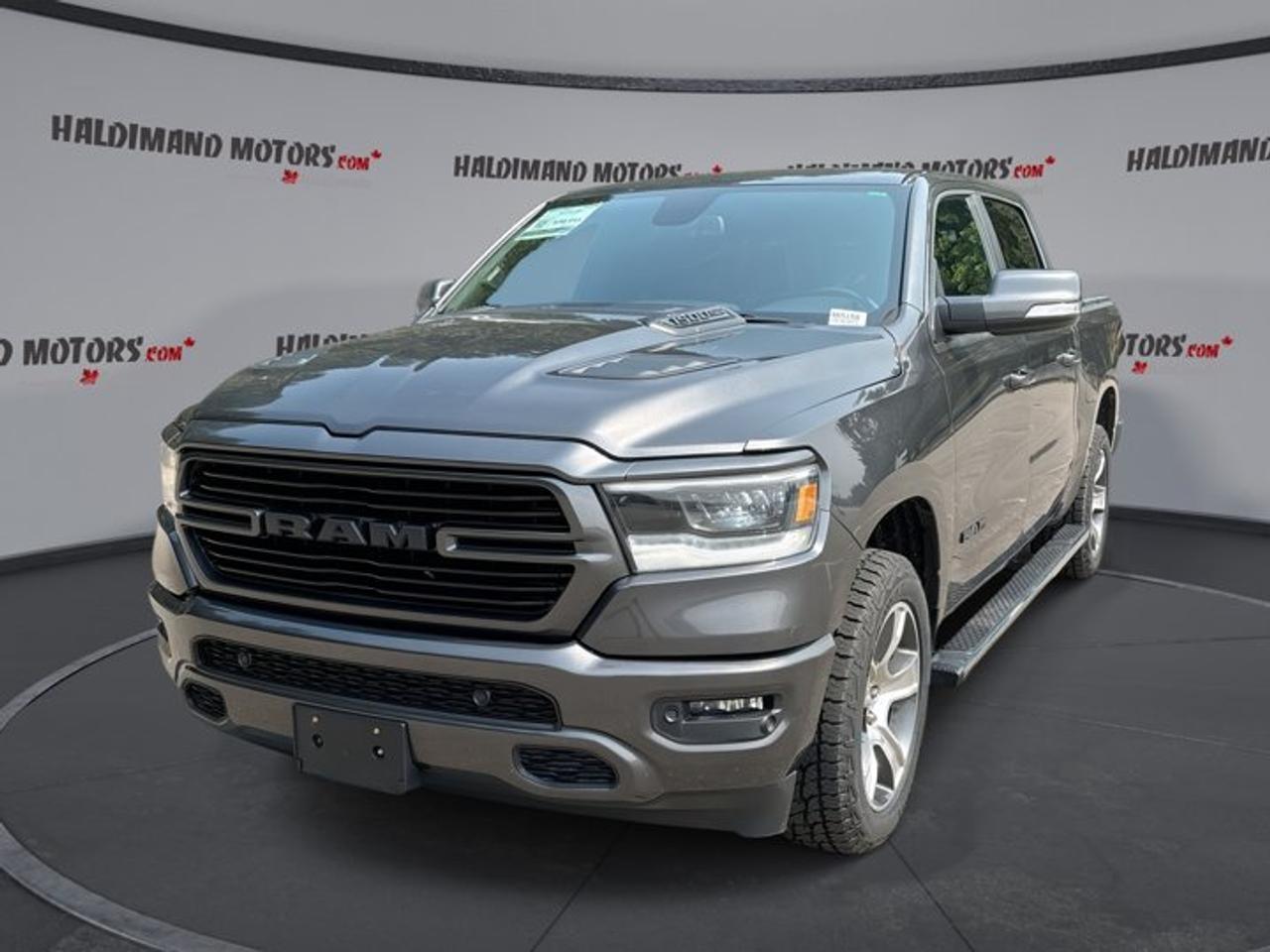 Built to work hard and drive with confidence, this 2019 RAM 1500 Sport Crew Cab 57 Box 4x4 brings strong V8 power, bold style, and everyday comfort together in one capable pickup. Finished in Grey with a Black interior, this used truck at Haldimand Motors Ltd. in Cayuga is well equipped for busy days, long trips, and weekend towing.<br /><br />With 151,475 km on the odometer, this 2019 RAM 1500 Sport Crew Cab 57 Box 4x4 still offers the muscle and refinement drivers expect from a full-size truck. Its 5.7-litre gas engine and 8-speed automatic transmission deliver smooth response, while Four-Wheel Drive helps you stay in control on rough roads, wet pavement, and changing Ontario weather.<br /><br />FEATURES OF THE 1500 Sport Crew Cab 57 Box 4x4 | Vent. Front Seats<br />   5.7-litre HEMI V8 power and torque<br />   Ventilated front seats for added comfort<br />   Panoramic sunroof brightens the cabin<br />   Sport styling with confident road presence<br /><br />TRUCK FEATURES<br />   Tows up to 5,120 kg confidently<br />   Trailer hitch ready for work<br />   Trailer brake controller adds towing control<br />   Rear tow hook supports truck utility<br /><br />ADVANCED SAFETY FEATURES<br />   Backup camera helps with reversing<br />   Anti-lock brakes support controlled stops<br />   Stability control adds confident handling<br />   Side and head airbags included<br /><br />PERFORMANCE AND EFFICIENCY<br />   5.7-litre gas V8 delivers strength<br />   Eight-speed automatic shifts smoothly<br />   Four-Wheel Drive boosts traction year-round<br />   Limited slip differential aids grip<br /><br />COMFORT AND CONVENIENCE<br />   Ventilated front seats add comfort<br />   Heated steering wheel for cold mornings<br />   Front air conditioning keeps cabin cool<br />   Power windows add daily ease<br /><br />TECHNONOLGY AND CONNECTIVITY<br />   Apple CarPlay keeps apps accessible<br />   Android Auto supports phone integration<br />   Bluetooth connection supports hands-free calling<br />   Wi-Fi hotspot adds online access<br /><br />CARGO SPACE<br />   Crew Cab adds practical passenger room<br />   57 box handles daily cargo<br />   Rear trunk access supports loading ease<br />   Four doors improve cabin entry<br /><br />AWARDS & RECOGNITIONS<br />   2019 Truck of the Year, MotorTrend, 2019<br />   Best Pickup Truck, Automobile Journalists Association of Canada, 2019<br /><br />WHAT OTHER OWNERS LIKE<br />   Strong HEMI V8 towing performance<br />   Smooth ride for a full-size truck<br />   Spacious Crew Cab passenger comfort<br />   User-friendly infotainment and controls<br /><br />This 2019 RAM 1500 Sport Crew Cab 57 Box 4x4 stands out with the right mix of power and premium touches. The panoramic sunroof opens up the cabin and adds a more open feel, while the leather-wrapped steering wheel, steering wheel audio controls, and adjustable steering wheel make every drive feel easy and well organized.<br /><br />This 2019 RAM 1500 Sport Crew Cab 57 Box 4x4 is also equipped with practical details that matter every day. Cruise control helps on highway drives, automatic headlights and fog lights support visibility, and tinted windows add privacy and style. LED headlamps provide a modern look and clear lighting when the road ahead gets dark.<br /><br />Inside, this 2019 RAM 1500 Sport Crew Cab 57 Box 4x4 offers a cabin designed for comfort and convenience. Drivers seat lumbar support and a power drivers seat help you find a comfortable position, while push button start and automatic door locks make daily use simple. Satellite radio and HD Radio give you more ways to enjoy the drive.<br /><br />For truck buyers who need real capability, this 2019 RAM 1500 Sport Crew Cab 57 Box 4x4 is ready to deliver. Whether you are towing equipment, carrying gear, or driving through changing road conditions, it has the strength, traction, and equipment to handle the job with confidence. Visit Haldimand Motors Ltd. in Cayuga to see this well-equipped RAM pickup for yourself.<br /><br />This 2019 RAM 1500 Sport Crew Cab 57 Box 4x4 | Vent. Front Seatss VIN is: 1C6SRFLT1KN855813 .<br /><br />WHY CHOOSE US? <br /><br />Honest & Transparent Buying Experience: Weve been a trusted name in business since 1984.<br /><br />STRAIGHTFORWARD PRICING:<br />Our Advertised Price Includes:<br />>>Safety Certification (No separate fee!)<br />>>30-Day 100% Mechanical Warranty<br />>>FREE Carfax History Report.<br />>>No upcharge for paying cash.<br />(Prices Exclude HST and Licensing Fees only.)<br /><br />>>Browse 300+ vehicles all in ONE LOCATION<br /><br />EASY FINANCING: Great rates & open loans<br /><br />WE BUY CARS: Get Top Dollar for your trade-in, or sell us your vehicle for CASH! Even if you dont buy from us!<br /><br />STOP BY TODAY<br />Treat yourself - stop by Haldimand Motors Ltd. located at 42 Talbot St E, Cayuga, ON N0A 1E0 to make this car yours today!<br /><br />https://www.haldimandmotors.com/used/stock-465158.html