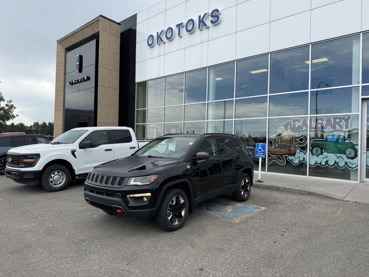 <p>Check out our One Owner and Accident Free 2018 Jeep Compass Trailhawk 4WD presented to you in Diamond Black Crystal Pearl. Driven by a 2.4 Litre 4 Cylinder that generates 180hp matched to a 9 Speed Automatic transmission for amazing power on or off the pavement. This Four Wheel Drive SUV provides a smooth, comfortable ride with plenty of get-up-and-go while scoring excellent fuel efficiency of approximately 7.6L/100km on the road. Skid platesa, a rasied ride height, and black alloy wheels highlight the distinct exterior.</p><p>Open the door to find the Trailhawk cabin has been tailor-made to fit your needs. It features leather heated front seats, a heated steering wheel, and our Uconnect® Touch/Hands-free interface with navigation.</p><p>Drive confidently, knowing Jeep offers ABS, stability/traction control, front-seat side airbags, and side curtain airbags on board to protect your precious cargo from harm. A brilliant blend of comfort and convenience, your Compass Trailhawk lets you go farther! Save this Page and Call for Availability. We Know You Will Enjoy Your Test Drive Toward Ownership! </p>