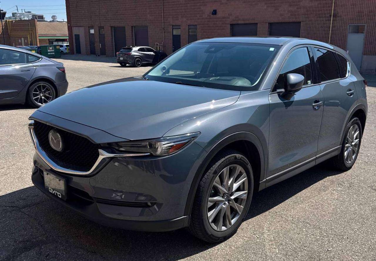 GT, AWD, Leather Seats, Heated Seats, Sunroof, Bose Premium Audio, Wireless Charging, Head-Up Display, Navigation, Heated Steering Wheel

Picture a crisp morning drive where the road ahead feels like it belongs to you  the 2021 Mazda CX-5 GT delivers exactly that kind of experience, wrapping driver and passengers in a cabin that punches well above its price point in refinement and attention to detail. Mazdas Skyactiv engineering philosophy shines here, balancing responsiveness with efficiency in a way that makes every journey feel effortless. In a crowded field of compact crossovers, the CX-5 has long been the drivers choice  and the GT represents the model at its most complete.

Available now at Car Central  Barries largest used car dealership and the most trusted in Simcoe County. Rated 4.9 stars on Google with over 1,200 five-star reviews, weve earned our reputation by making car buying simple, best price upfront, no haggling, no pressure. With 200+ vehicles in stock and a team that puts you first, come see why more people choose Car Central than anywhere else in the region.

CARFAX: Free Carfax report on all our listing. Just go on our website and click view Carfax report.


CERTIFICATION: Have your new pre-owned vehicle certified at Car Central! We offer a full safety inspection exceeding industry standards including oil change, and professional detailing prior to delivery. Vehicles are not drivable, if not certified and not e-tested, certification package is available for $749. All trade-ins are welcome. Taxes, licensing are extra.


PRICE: We believe everyone deserves to get the best price possible on their new pre-owned vehicle without having to go through uncomfortable negotiations. Our Market Value Pricing (MVP) allows you to buy with confidence. We do this by constantly monitoring the market and adjusting our prices below the market average you can buy confidently knowing you are getting the best price possible! No haggle pricing. No pressure. Why pay more somewhere else. **CASH PRICE** will be an additional $1750 and it will include 1 Year or 15,000 kms Powertrain warranty. 


SERVICE: Schedule an appointment with Car Central Service Centre to bring your vehicle in for all its needs. Simply click on the link below and book your appointment. Our licensed technicians and repair facility offer the highest quality services at the most competitive prices. All work is manufacturer warranty approved and comes with 2-year parts and labour warranty. Start saving hundreds of dollars by servicing your vehicle with Car Central. Call us at 705-503-5000 or follow this link to book an appointment today! https://www.carcentral.ca/contact-us/


WARRANTY: This vehicle qualifies for an extended warranty with different terms and coverages available. Dont forget to ask for help choosing the right one for you.


FINANCING: No credit? New to the country? Bankruptcy? Consumer proposal? Collections? You dont need good credit to finance a vehicle. Bad credit is usually good enough. Give our finance and credit experts a chance to get you approved and start rebuilding credit today! On the spot financing, instant approvals, and no payments for 6 months is also available O.A.C!


Any vehicle stock number starting with Letter R are Previous daily Rental.


With over 30 years of experience, Car Central is a proud family-owned business and a trusted member of the UCDA. Our mission is to offer not only the best prices but also high-quality, reliable vehicles and an exceptional customer experience. We believe in making your car buying journey stress-free, with absolutely no pressurejust honest service you can rely on."